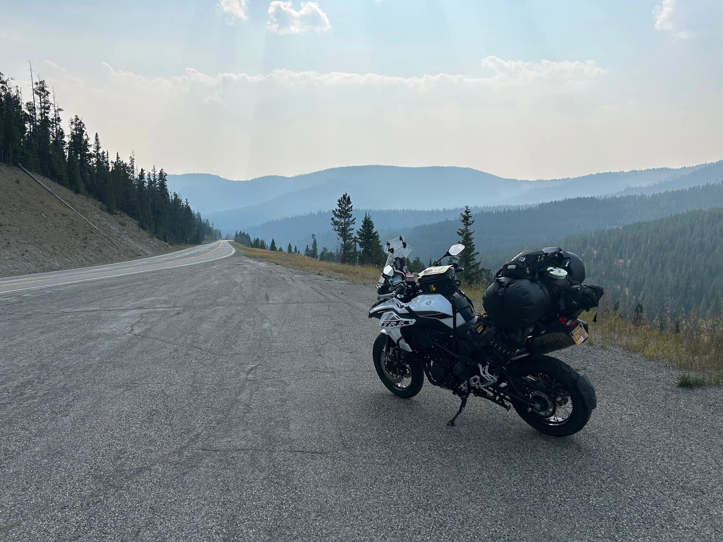 Trip Report: NW National Parks Loop
I left my job recently to take a much needed sabbatical and figure out what I’m doing next. A few weeks after my last day at work I embarked on what was to be a three week tour of NW-ish National Parks from Portland, to include Olympic, North Cascades, Glacier, Yellowstone, Grand Teton, Craters of the Moon, Lassen Volcanic, and Crater Lake.
I ended up missing Grand Tetons due to weather and I had to cut the trip short before I got to Lassen (family medical issue), so Lassen and Crater Lake remain unvisited.
Trip Dates: Sept 3 - Sept 16 (13 days)
Total Travel Miles: 3478 (does not include local miles for store runs, etc.)
Total Gallons of Gas Used: 82
Equipment: 2021 Benelli TRK502X Gaia GPS & Google Maps running on Sonim XP8 rugged Android phoneButler Motorcycle Maps (paper maps of best M/C roads in the country) iPhone 14 (main camera) Akaso Brave 7 helmet-mounted adventure camera Spot X satellite communicator and tracker Wolfman Luggage WP waterproof tank bag and saddle bags (no longer available) Watershed Colorado dry bag duffel (across the pillion seat) Kriega US-5 Drypack (tail bag) Kriega 3L hydration backpack (strapped to duffel, not worn)Marmot Ajax 2 tent Nemo hydrophobic down sleeping bag (non-mummy)Helinox ultralight cot MSR WhisperLite International stove
(Purchased in 1991 for my first moto trip: Detroit, MI to San Diego and back on an XT250)Gossamer Gear Bare Boxer bear-proof food canisters (two - one in each saddle bag)
Day 1 - Olympic National Park Date: Tuesday 9/3/2024
Destination: South Beach Campground, Olympic National Park
Travel Time: 4h 24m
Miles: 213Notes:
Planned to head west to Astoria then north from there, but left later than expected so headed up I-5 to US 12. I’ve driven/ridden that stretch of I-5 hundreds of times (starting in 1993). It’s boring and I hate it.
South Beach CG is first-come-first-served. I didn’t have issue getting a site. There is a long, tight loop of sites along the coastline, but I chose one of the sites further back near the bathrooms due to wind concerns. The bathroom building provided a sort of wind shelter for my site.
I used the heated grips on this leg; it was pretty chilly along the coast in the Olympic Peninsula. I almost didn’t install them, thinking I was being paranoid about the cold. I ended up using them a lot.
Day 2 - Ferry to Seattle / Burien Date: Wednesday 9/4/2024
Destination: Friend’s house in Burien, WA
Travel Time: 7h 30m
Miles: 199
Notes:
Slept well (thanks to Advil PM). I’ve not been sleeping well for more than a year. I’m really hoping to reset my sleep patterns with this trip. A good night’s sleep is one of my great joys and I feel like I’ve been robbed of that pleasure.
Used my Aeropress this morning for the first time ever. I’m hooked.
Headed up along US 101 through Port Angeles and then down to the Southworth ferry terminal near Port Orchard. Ferried across to Fauntleroy, which is just a few miles north my friend’s house in Burien. I’m always surprised at how long it takes to get from the Olympic Peninsula to the east side of Puget Sound (Seattle, etc.). With the ferry crossing (I love ferries) it took seven and a half hours to go 200 miles.
Discovered at my first stop of the day (just up 101 at the Kalaloch Campground, stopped to refill water) that the battery is quite weak and won’t start the bike if you leave the ignition on for even two minutes without the motor running. This would become a theme for the next few days. Fortunately, I have a jumper box and a permanent jump harness wired to the battery so jump starts are a quick operation.
Had a good evening with old friends.
Day 3 - North Cascades via Mountain Loop RoadDate: Thursday 9/5/2024
Destination: Newhalem Campground, North Cascades National Park
Travel Time: 4h 30m
Miles: 146Notes:
Slept well, on the couch. No pills needed.
I realized yesterday that my summer riding gloves (Rev’It Dune) were a size (or two) too small. Rev’It gloves fit really tight and I feel like I can never get it quite right. And yet, I love them. So, I stopped at a Cycle Gear in Bellevue to pick up something summer weight (Dirt 3) that fit better. They’re better, but maybe still one size too small. Such is life.
From Bellevue, I rode north and took the Mountain Loop Hwy then on up north to North Cascades. It was a hot ride. Still summer.
A small section of the Mountain Loop Road is dirt/gravel, which I didn’t realize. No biggie. Was just surprised (clearly I didn’t study my maps closely enough). When riding solo on a bike that weighs over 500 lbs., I tend to avoid planning much off-pavement riding. That’s what my DR-Z is for.
Day 4 - Newport, Washington via Winthrop Date: Friday 9/6/2024
Destination: Golden Spur Motor Inn, Newport, Washington
Travel Time: 8h
Miles: 308
Notes:
Slept just ok, even with Advil PM.
Pretty ride through North Cascades National Park and Colville National Forest. Didn’t do any backroads or hikes. Discovered (new to me) the town of Winthrop. Stopped for coffee at Sheri’s and resupplied on freeze-dried food at Cascades Outdoor Store.
The town of Newport is almost nothing, but, inexplicably, there’s an amazing restaurant (Brownell’s Place). Had dinner and a few ciders. Met and chatted with the owner/chef (she’s great). Listened to some live music. Then back to the motel.
Day 5 - New Battery in Kalispell Date: Saturday 9/7/2024
Destination: West Glacier KOA, West Glacier, MT
Travel Time: 8h 7m
Miles: 293
Notes:
Slept well on motel bed (on sleeping bag, not in the sheets). Another hot one.
Discovered that the water pump seal leaks oil. A quick post in the TRK Facebook group revealed that this is a common problem on this bike, and and easy fix. It’s apparently just a bad o-ring.
Battery has been getting continuously worse, and now requires I jump start the bike about every other start. Google Maps to the rescue: directions to the Batteries Plus in Kalispell, please. They don’t have an Odyssey AGM in the right size; the Duracell will have to do. (It’s been great.)
I set up camp at the West Glacier KOA, which will be my base for a few days. KOAs are their own little world. Very strange. Not really my thing, but the on-site laundry was handy.
After setting up camp I opened a cider and used the iPad to book a vehicle reservation for the next day to ride Going to the Sun Road, which I really wanted to do.
Day 6 - Going to the Sun RoadDate: Sunday 9/8/2024
Destination: Local Ride: West Glacier, Going to the Sun Road, Saint Mary, East Glacier
Travel Time: 5h 35m
Miles: 142Notes:
Quick breakfast and gas up in West Glacier before entering Going to the Sun Road.
Going to the Sun Road was stunning. This was the first point in the trip where I had tingles and was giddy at what I was seeing.
Took a very short hike along Saint Mary Lake. Again, I was beside myself with the beauty.
Lunch at the general store in Kiowa.
The rest of the ride back after East Glacier was meh, but I just kept thinking about how amazing what I’d seen in the morning had been.
Dinner at the KOA. Tacos from a cart (ok / not great, and a very weird guacamole) and a few glasses of wine from another cart. I asked about the guac and it turns out they make it in a food processor. Come on, people.
Day 7 - Ride to BozemanDate: Monday 9/9/2024
Destination: Friend’s house in Bozeman, Montana
Travel Time: ~ 8h (Gaia crashed near the end of the trip, but before getting to Bozeman)
Miles: ~ 400Notes:
Slept poorly again. No pills this time. Took some photos of my soft luggage setup to answer some questions in the TRK502X Facebook group. The saddle bags are from Wolfman Luggage, but I don’t think they make this waterproof line anymore. I use a duffel dry bag from Watershed across the top. A heat shield protects the side bag from exhaust heat.
Hazy, smoky ride most of the way. Very windy in places. This is where I first really started to feel how underpowered the TRK502 is. Really struggled in places.
Developed an engine-speed-sensitive squeak or rattle. Sounds like when a heat shield vibrates in resonance with engine vibration. Discovered that it’s a missing crash bar mounting bolt allowing the crash bar to rub against the frame.
Also noticed that there’s a resonant oscillation at speed that feels like the chain going bad (like it’s stretching unevenly).
First of several nights at a friend’s house in Bozeman (which, it turns out, is a pretty cool town). And there’s a hot tub…
Day 8 - Bike Maintenance & Hyalite ReservoirDate: Tuesday 9/10/2024
Destination: Local Ride: Hyalite Reservoir
Travel Time: not recorded
Miles: not recordedNotes:
Woke up to a smoky sunrise. I had the best night’s sleep I’ve had in years. This is was the whole point of this trip: to untangle my burnout and reclaim sleep as one of my joys. I wrote about it in my journal when I woke up. I hope this wasn’t a fluke.
Planned to replace the bolt that rattled loose from the crash bar, but instead discovered that it had actually severed off at the mount point. No fixing that on the road. Adjusted chain and moved on.
Lunch at Mountains Walking Brewery in Bozeman.
Rode up to Hyalite Reservoir. Pretty ride. Smoky still.
Soaked in hot tub after dinner.
Day 9 - North Yellowstone LoopDate: Wednesday 9/11/2024
Destination: Northern loop through Yellowstone National Park
Travel Time: 9h 36m
Miles: 272Notes:
Did a day trip from Bozeman down through the northern loop in Yellowstone, entering at Mammoth and taking the scenic route through Paradise Valley.
Saw elk, coyotes (I think), buffalo, and pronghorn.
Pretty ride, but cold in places. Used heated grips again.
Rode the loop through Mammoth Hot Springs (see video) at the end.
Coffee at Tumbleweed Bookstore & Cafe in Gardiner. I kind of dig Gardiner. Good vibe.
Had dinner at Mountains Walking Brewing. Rain and wind started. Lights flickered. Waited for rain to stop before riding back to the house.
Power out at the house due to high winds. This does not bode well for tomorrow.
Day 10 - Winter Weather in the ParksDate: Thursday 9/12/2024
Destination: Grand Teton National Park via West Yellowstone Pocatello, Idaho
Travel Time: 5h 40m
Miles: 201Notes:
Today was supposed to be a gorgeous ride through Yellowstone into Grand Teton National Park, and camping at Signal Mountain CG in the park. The weather had other ideas. It was pouring rain (and cold) all the way to West Yellowstone from Bozeman. By the time I got to West Yellowstone I was getting severe winter weather warnings on my phone calling for up to 3 (three!!) inches of snow accumulating in the high passes in the park. It’s bad enough in a car, but that’s a disaster waiting to happen on a motorcycle.
I parked my butt at Mountain Mama’s Cafe in West Yellowstone to warm up / dry off and decide what to do. I almost had myself convinced to push through when I realized that, even if I made it to the campground ok, I’d be setting up camp in the rain and I’d likely be miserable all night. Grand Teton would have to wait.
From West Yellowstone it’s easy to bail west into Idaho and get away from the park weather and elevations. So that’s what I did. It was not a pleasant ride, though. I was in torrential downpours all the way to Idaho Falls.
Arriving in Idaho Falls, I was exhausted and sure I could just find a room for the night. I dropped the bike at a roundabout (short-legged it coming to a stop; I knew it was going so I just rolled away). Guy behind me helped me pick it up. Then, there were no rooms because it was move in week for the two universities there (U of I, ISU). This would become a recurring theme.
I rode further to Blackfoot. Still no rooms.
I called ahead to Pocatello and got a room at a Red Lion there. I was never so happy to be off the bike.
No pictures this day. I couldn’t even get the action camera to turn on.
Day 11 - Craters of the Moon and EBR-1Date: Friday 9/13/2024
Destination: Craters of the Moon National Monument
Travel Time: 4h 20m
Miles: 124
Notes:
I wasn’t sure what my destination would be today but my plan was to do a little nuclear tourism, see Craters of the Moon, and then go somewhere from there. My schedule and day-plan was thrown off by missing Grand Teton National Park and spending a night in Pocatello, which was not on the itinerary at all.
Stopped in Atomic City. Not sure why; I was under the impression that Atomic City was the first city lit by nuclear engergy, but it was practically a ghost town. There are a few houses there, but as far as I could tell all of the business were shuttered. Except, maybe, for the race track; that looked like it might still get used.
Arco, it turns out, is the city celebrated as the first in the world to be lit by nuclear energy. Nothing special about the town, but they do a nice job of making City Hall photo-worthy.
Between Atomic City and Arco is EBR-1 (Experimental Breeder Reactor I) which was the world’s first breeder reactor. The EBR-1 exhibit was closed for the season, but in the lot next to it were some really interesting experimental nuclear heat-transfer jet engines that never made it out of the experimental phase (probably a good thing).
Craters of the Moon is pretty small. If you don’t do any of the walks, it’s literally just a 30 minute road loop. Still, it was an unexpected surprise and delight. I had no idea what to expect but I was positively chuffed at the experience. I noticed that the campground had open sites so I inquired at the entry booth. As luck would have it, the whole campground is first come / first serve. I decided to set up for the night. It’s good to be done early and have some time to read and not stress about making distance.
Day 12 - New Chain in Twin FallsDate: Saturday 9/14/2024
Destination: Battle Mountain, Nevada
Travel Time: 8h 52m
Miles: 335
Notes:
Beautiful morning in Craters of the Moon. While I was breaking camp a parade of classic cars came into the park to drive the loop. I got a picture of one Pontiac down the road in Carey at a gas station.
Carey ended up being an unplanned fork in the road for me. I discovered this morning that my chain was indeed stretching unevenly, and the oscillation I was feeling and hearing was the chain hum changing from a “loose” hum to a “tight” hum rapidly as the tight spot moved around the sprockets. I was supposed to continue west to Mountain Home and then south from there into Nevada. A very scenic route, according to my Butler map. But, between camp and the gas station I got pretty paranoid about the chain snapping at high speed, which, worst case, could lead to a fatal crash.
So I called ahead to a few motorcycle dealers in Mountain Home (on my planned route) to see if they could take me in and replace the chain. No dice. This is the downside of having an obscure motorcycle from an obscure marque - no one wants to work on it. Making matters worse this is an Italian-designed bike built in China, a fact which causes many people to lose the ability to think clearly. “It’s Chinese junk!” Not so. Next.
With Mountain Home out, I tried Twin Falls. My first call was to Adventure Motorsports, and the service manager there took me in with no hesitation. “How soon can you be here?” I didn’t get his name, but my hat’s off to him and his one tech working furiously on a Saturday to beat the 3pm closing time. He said during high season, they get about 15-20 out of town travelers per week who need something done, and they take them all in. I love to hear stuff like this. This shop is in it for the community. They have a nice showroom, too.
With a quality new chain installed, I got a burrito and a MexiCoke at a Mexican place and went on my way. I made it to Battle Mountain, NV, where I decide to get a room. Tomorrow I rejoin my planned scenic route. Day 13 - Desert Mountains in NV, CADate: Sunday 9/15/2024
Destination: Grizzly Campground, Lake Davis (near Portola, CA)
Travel Time: 7h
Miles: 307
Notes:
I love the northern Nevada landscape, and today’s ride didn’t disappoint. US Highway 50 is apparently known as “The Loneliest Highway” but everyone knows about it, so it’s not very lonely. However, after leaving Austin, NV headed west you can take Nevada Highway 722, which dips to the south and follows the old US 50 route. It was completely empty and the twisties through the passes were fun. Highly recommended.
Stopped in Fallon for gas and to find a Micro SD card for the action camera. Walmart to the rescue.
After Reno, I crossed into California and, I swear, it looks different. Norther California desert mountains are so beautiful.
Camped at a nearly empty campground on Lake Davis (very end of the season). The host warned me rain was coming tomorrow.
Day 14 - Unplanned Return HomeDate: Monday 9/16/2024
Destination: Summit Lake Campground, Lassen Volcanic National Park Portland, Oregon (Home)
Travel Time: 10h 32m
Miles: 538Notes:
Last week, my mom went into the hospital for a fairly routine procedure. My brother went to Michigan to help out, as needed, and he went back home to Arizona after she returned home and everything seemed settled.
This morning, while having coffee, I got a call that she’d gone back into the hospital with something that may or may not have been related to the procedure. It seemed like maybe things were ok, but maybe not.
I decided the best thing to do was head home so that I was near an airport if I needed to fly out to Michigan to help out.
I packed up camp and headed up US 395 toward home, via Klamath Falls. It was a pretty ride, but, once again, I found myself in rain most of the way to Klamath Falls.
I was pretty beat by the time I got to Klamath Falls and figured I’d just find a hotel room, get a hot shower, and finish the ride tomorrow.
But, once again, it was move-in week for the local university. Holiday Inn Express had a single room for $395. No thanks. Onward.
I never hit rain again after Klamath Falls, and after turning west onto Oregon Hwy 58 and starting to lose elevation into the Willamette Valley, the temperature starting rising, which was welcome.
Once I reached Eugene, there was no point in not just going all the way home, so that’s what I did.
I got two pictures: one at camp before the call, and one at my last gas stop, an hour and twenty minutes from home, with the moon rising.
A nice side effect of my early return home is that I was home for my birthday (tomorrow), so I had dinner with my kids and my wife, which was lovely.
I did end up flying to Michigan the next day, and was there for a bit. The best part? I got to make some meals for my mom and step dad. Everything seems ok with my mom for now.
Grand Teton, Lassen, and Crater Lake will be there, and now I have an excuse for another trip in the future.