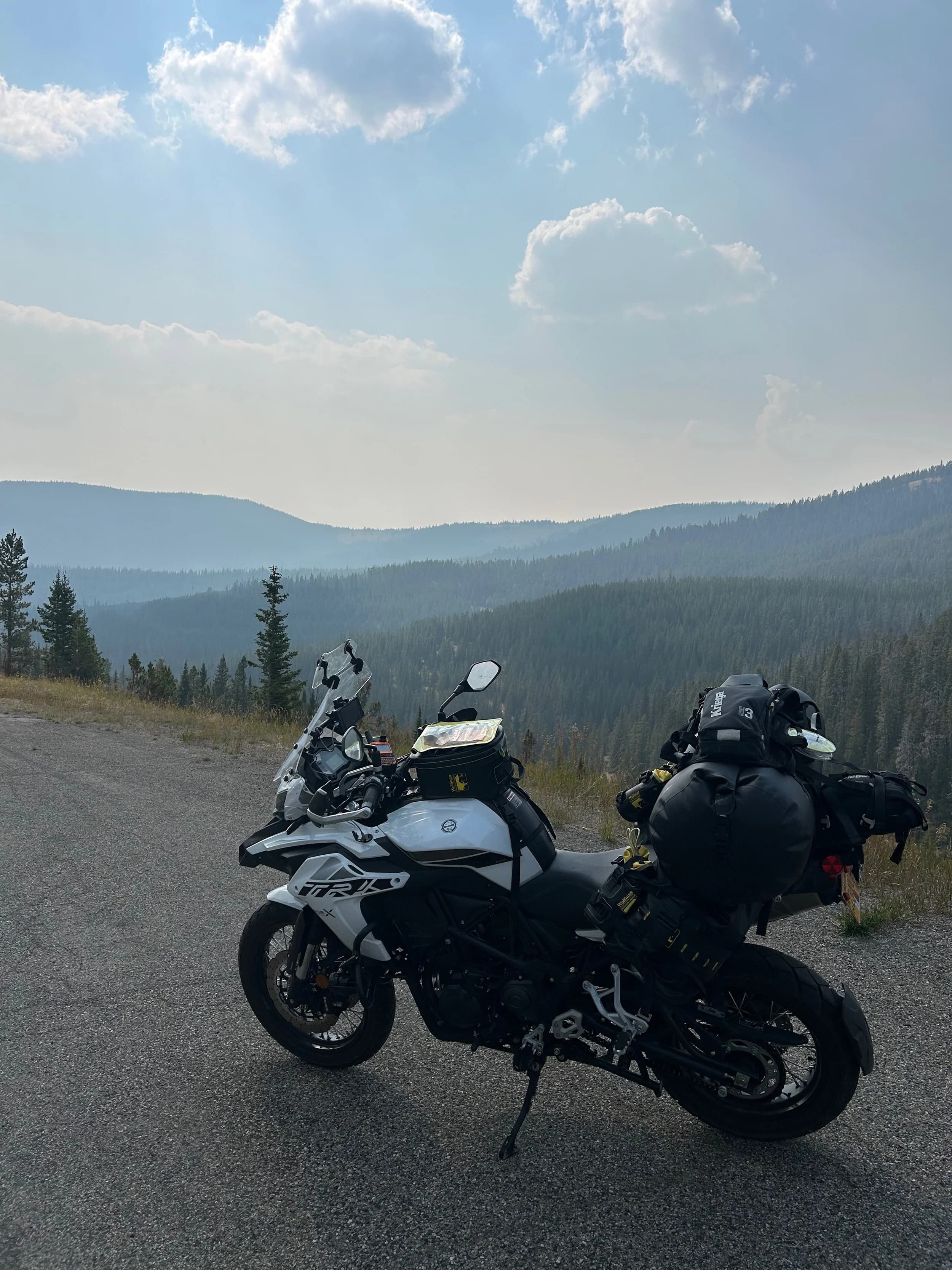 Trip Report: NW National Parks Loop
I left my job recently to take a much needed sabbatical and figure out what I’m doing next. A few weeks after my last day at work I embarked on what was to be a three week tour of NW-ish National Parks from Portland, to include Olympic, North Cascades, Glacier, Yellowstone, Grand Teton, Craters of the Moon, Lassen Volcanic, and Crater Lake.
I ended up missing Grand Tetons due to weather and I had to cut the trip short before I got to Lassen (family medical issue), so Lassen and Crater Lake remain unvisited.
Trip Dates: Sept 3 - Sept 16 (13 days)
Total Travel Miles: 3478 (does not include local miles for store runs, etc.)
Total Gallons of Gas Used: 82
Equipment: 2021 Benelli TRK502X Gaia GPS & Google Maps running on Sonim XP8 rugged Android phoneButler Motorcycle Maps (paper maps of best M/C roads in the country) iPhone 14 (main camera) Akaso Brave 7 helmet-mounted adventure camera Spot X satellite communicator and tracker Wolfman Luggage WP waterproof tank bag and saddle bags (no longer available) Watershed Colorado dry bag duffel (across the pillion seat) Kriega US-5 Drypack (tail bag) Kriega 3L hydration backpack (strapped to duffel, not worn)Marmot Ajax 2 tent Nemo hydrophobic down sleeping bag (non-mummy)Helinox ultralight cot MSR WhisperLite International stove
(Purchased in 1991 for my first moto trip: Detroit, MI to San Diego and back on an XT250)Gossamer Gear Bare Boxer bear-proof food canisters (two - one in each saddle bag)
Day 1 - Olympic National Park Date: Tuesday 9/3/2024
Destination: South Beach Campground, Olympic National Park
Travel Time: 4h 24m
Miles: 213Notes:
Planned to head west to Astoria then north from there, but left later than expected so headed up I-5 to US 12. I’ve driven/ridden that stretch of I-5 hundreds of times (starting in 1993). It’s boring and I hate it.
South Beach CG is first-come-first-served. I didn’t have issue getting a site. There is a long, tight loop of sites along the coastline, but I chose one of the sites further back near the bathrooms due to wind concerns. The bathroom building provided a sort of wind shelter for my site.
I used the heated grips on this leg; it was pretty chilly along the coast in the Olympic Peninsula. I almost didn’t install them, thinking I was being paranoid about the cold. I ended up using them a lot.
Day 2 - Ferry to Seattle / Burien Date: Wednesday 9/4/2024
Destination: Friend’s house in Burien, WA
Travel Time: 7h 30m
Miles: 199
Notes:
Slept well (thanks to Advil PM). I’ve not been sleeping well for more than a year. I’m really hoping to reset my sleep patterns with this trip. A good night’s sleep is one of my great joys and I feel like I’ve been robbed of that pleasure.
Used my Aeropress this morning for the first time ever. I’m hooked.
Headed up along US 101 through Port Angeles and then down to the Southworth ferry terminal near Port Orchard. Ferried across to Fauntleroy, which is just a few miles north my friend’s house in Burien. I’m always surprised at how long it takes to get from the Olympic Peninsula to the east side of Puget Sound (Seattle, etc.). With the ferry crossing (I love ferries) it took seven and a half hours to go 200 miles.
Discovered at my first stop of the day (just up 101 at the Kalaloch Campground, stopped to refill water) that the battery is quite weak and won’t start the bike if you leave the ignition on for even two minutes without the motor running. This would become a theme for the next few days. Fortunately, I have a jumper box and a permanent jump harness wired to the battery so jump starts are a quick operation.
Had a good evening with old friends.
Day 3 - North Cascades via Mountain Loop RoadDate: Thursday 9/5/2024
Destination: Newhalem Campground, North Cascades National Park
Travel Time: 4h 30m
Miles: 146Notes:
Slept well, on the couch. No pills needed.
I realized yesterday that my summer riding gloves (Rev’It Dune) were a size (or two) too small. Rev’It gloves fit really tight and I feel like I can never get it quite right. And yet, I love them. So, I stopped at a Cycle Gear in Bellevue to pick up something summer weight (Dirt 3) that fit better. They’re better, but maybe still one size too small. Such is life.
From Bellevue, I rode north and took the Mountain Loop Hwy then on up north to North Cascades. It was a hot ride. Still summer.
A small section of the Mountain Loop Road is dirt/gravel, which I didn’t realize. No biggie. Was just surprised (clearly I didn’t study my maps closely enough). When riding solo on a bike that weighs over 500 lbs., I tend to avoid planning much off-pavement riding. That’s what my DR-Z is for.
Day 4 - Newport, Washington via Winthrop Date: Friday 9/6/2024
Destination: Golden Spur Motor Inn, Newport, Washington
Travel Time: 8h
Miles: 308
Notes:
Slept just ok, even with Advil PM.
Pretty ride through North Cascades National Park and Colville National Forest. Didn’t do any backroads or hikes. Discovered (new to me) the town of Winthrop. Stopped for coffee at Sheri’s and resupplied on freeze-dried food at Cascades Outdoor Store.
The town of Newport is almost nothing, but, inexplicably, there’s an amazing restaurant (Brownell’s Place). Had dinner and a few ciders. Met and chatted with the owner/chef (she’s great). Listened to some live music. Then back to the motel.
Day 5 - New Battery in Kalispell Date: Saturday 9/7/2024
Destination: West Glacier KOA, West Glacier, MT
Travel Time: 8h 7m
Miles: 293
Notes:
Slept well on motel bed (on sleeping bag, not in the sheets). Another hot one.
Discovered that the water pump seal leaks oil. A quick post in the TRK Facebook group revealed that this is a common problem on this bike, and and easy fix. It’s apparently just a bad o-ring.
Battery has been getting continuously worse, and now requires I jump start the bike about every other start. Google Maps to the rescue: directions to the Batteries Plus in Kalispell, please. They don’t have an Odyssey AGM in the right size; the Duracell will have to do. (It’s been great.)
I set up camp at the West Glacier KOA, which will be my base for a few days. KOAs are their own little world. Very strange. Not really my thing, but the on-site laundry was handy.
After setting up camp I opened a cider and used the iPad to book a vehicle reservation for the next day to ride Going to the Sun Road, which I really wanted to do.
Day 6 - Going to the Sun RoadDate: Sunday 9/8/2024
Destination: Local Ride: West Glacier, Going to the Sun Road, Saint Mary, East Glacier
Travel Time: 5h 35m
Miles: 142Notes:
Quick breakfast and gas up in West Glacier before entering Going to the Sun Road.
Going to the Sun Road was stunning. This was the first point in the trip where I had tingles and was giddy at what I was seeing.
Took a very short hike along Saint Mary Lake. Again, I was beside myself with the beauty.
Lunch at the general store in Kiowa.
The rest of the ride back after East Glacier was meh, but I just kept thinking about how amazing what I’d seen in the morning had been.
Dinner at the KOA. Tacos from a cart (ok / not great, and a very weird guacamole) and a few glasses of wine from another cart. I asked about the guac and it turns out they make it in a food processor. Come on, people.
Day 7 - Ride to BozemanDate: Monday 9/9/2024
Destination: Friend’s house in Bozeman, Montana
Travel Time: ~ 8h (Gaia crashed near the end of the trip, but before getting to Bozeman)
Miles: ~ 400Notes:
Slept poorly again. No pills this time. Took some photos of my soft luggage setup to answer some questions in the TRK502X Facebook group. The saddle bags are from Wolfman Luggage, but I don’t think they make this waterproof line anymore. I use a duffel dry bag from Watershed across the top. A heat shield protects the side bag from exhaust heat.
Hazy, smoky ride most of the way. Very windy in places. This is where I first really started to feel how underpowered the TRK502 is. Really struggled in places.
Developed an engine-speed-sensitive squeak or rattle. Sounds like when a heat shield vibrates in resonance with engine vibration. Discovered that it’s a missing crash bar mounting bolt allowing the crash bar to rub against the frame.
Also noticed that there’s a resonant oscillation at speed that feels like the chain going bad (like it’s stretching unevenly).
First of several nights at a friend’s house in Bozeman (which, it turns out, is a pretty cool town). And there’s a hot tub…
Day 8 - Bike Maintenance & Hyalite ReservoirDate: Tuesday 9/10/2024
Destination: Local Ride: Hyalite Reservoir
Travel Time: not recorded
Miles: not recordedNotes:
Woke up to a smoky sunrise. I had the best night’s sleep I’ve had in years. This is was the whole point of this trip: to untangle my burnout and reclaim sleep as one of my joys. I wrote about it in my journal when I woke up. I hope this wasn’t a fluke.
Planned to replace the bolt that rattled loose from the crash bar, but instead discovered that it had actually severed off at the mount point. No fixing that on the road. Adjusted chain and moved on.
Lunch at Mountains Walking Brewery in Bozeman.
Rode up to Hyalite Reservoir. Pretty ride. Smoky still.
Soaked in hot tub after dinner.
Day 9 - North Yellowstone LoopDate: Wednesday 9/11/2024
Destination: Northern loop through Yellowstone National Park
Travel Time: 9h 36m
Miles: 272Notes:
Did a day trip from Bozeman down through the northern loop in Yellowstone, entering at Mammoth and taking the scenic route through Paradise Valley.
Saw elk, coyotes (I think), buffalo, and pronghorn.
Pretty ride, but cold in places. Used heated grips again.
Rode the loop through Mammoth Hot Springs (see video) at the end.
Coffee at Tumbleweed Bookstore & Cafe in Gardiner. I kind of dig Gardiner. Good vibe.
Had dinner at Mountains Walking Brewing. Rain and wind started. Lights flickered. Waited for rain to stop before riding back to the house.
Power out at the house due to high winds. This does not bode well for tomorrow.
Day 10 - Winter Weather in the ParksDate: Thursday 9/12/2024
Destination: Grand Teton National Park via West Yellowstone Pocatello, Idaho
Travel Time: 5h 40m
Miles: 201Notes:
Today was supposed to be a gorgeous ride through Yellowstone into Grand Teton National Park, and camping at Signal Mountain CG in the park. The weather had other ideas. It was pouring rain (and cold) all the way to West Yellowstone from Bozeman. By the time I got to West Yellowstone I was getting severe winter weather warnings on my phone calling for up to 3 (three!!) inches of snow accumulating in the high passes in the park. It’s bad enough in a car, but that’s a disaster waiting to happen on a motorcycle.
I parked my butt at Mountain Mama’s Cafe in West Yellowstone to warm up / dry off and decide what to do. I almost had myself convinced to push through when I realized that, even if I made it to the campground ok, I’d be setting up camp in the rain and I’d likely be miserable all night. Grand Teton would have to wait.
From West Yellowstone it’s easy to bail west into Idaho and get away from the park weather and elevations. So that’s what I did. It was not a pleasant ride, though. I was in torrential downpours all the way to Idaho Falls.
Arriving in Idaho Falls, I was exhausted and sure I could just find a room for the night. I dropped the bike at a roundabout (short-legged it coming to a stop; I knew it was going so I just rolled away). Guy behind me helped me pick it up. Then, there were no rooms because it was move in week for the two universities there (U of I, ISU). This would become a recurring theme.
I rode further to Blackfoot. Still no rooms.
I called ahead to Pocatello and got a room at a Red Lion there. I was never so happy to be off the bike.
No pictures this day. I couldn’t even get the action camera to turn on.
Day 11 - Craters of the Moon and EBR-1Date: Friday 9/13/2024
Destination: Craters of the Moon National Monument
Travel Time: 4h 20m
Miles: 124
Notes:
I wasn’t sure what my destination would be today but my plan was to do a little nuclear tourism, see Craters of the Moon, and then go somewhere from there. My schedule and day-plan was thrown off by missing Grand Teton National Park and spending a night in Pocatello, which was not on the itinerary at all.
Stopped in Atomic City. Not sure why; I was under the impression that Atomic City was the first city lit by nuclear engergy, but it was practically a ghost town. There are a few houses there, but as far as I could tell all of the business were shuttered. Except, maybe, for the race track; that looked like it might still get used.
Arco, it turns out, is the city celebrated as the first in the world to be lit by nuclear energy. Nothing special about the town, but they do a nice job of making City Hall photo-worthy.
Between Atomic City and Arco is EBR-1 (Experimental Breeder Reactor I) which was the world’s first breeder reactor. The EBR-1 exhibit was closed for the season, but in the lot next to it were some really interesting experimental nuclear heat-transfer jet engines that never made it out of the experimental phase (probably a good thing).
Craters of the Moon is pretty small. If you don’t do any of the walks, it’s literally just a 30 minute road loop. Still, it was an unexpected surprise and delight. I had no idea what to expect but I was positively chuffed at the experience. I noticed that the campground had open sites so I inquired at the entry booth. As luck would have it, the whole campground is first come / first serve. I decided to set up for the night. It’s good to be done early and have some time to read and not stress about making distance.
Day 12 - New Chain in Twin FallsDate: Saturday 9/14/2024
Destination: Battle Mountain, Nevada
Travel Time: 8h 52m
Miles: 335
Notes:
Beautiful morning in Craters of the Moon. While I was breaking camp a parade of classic cars came into the park to drive the loop. I got a picture of one Pontiac down the road in Carey at a gas station.
Carey ended up being an unplanned fork in the road for me. I discovered this morning that my chain was indeed stretching unevenly, and the oscillation I was feeling and hearing was the chain hum changing from a “loose” hum to a “tight” hum rapidly as the tight spot moved around the sprockets. I was supposed to continue west to Mountain Home and then south from there into Nevada. A very scenic route, according to my Butler map. But, between camp and the gas station I got pretty paranoid about the chain snapping at high speed, which, worst case, could lead to a fatal crash.
So I called ahead to a few motorcycle dealers in Mountain Home (on my planned route) to see if they could take me in and replace the chain. No dice. This is the downside of having an obscure motorcycle from an obscure marque - no one wants to work on it. Making matters worse this is an Italian-designed bike built in China, a fact which causes many people to lose the ability to think clearly. “It’s Chinese junk!” Not so. Next.
With Mountain Home out, I tried Twin Falls. My first call was to Adventure Motorsports, and the service manager there took me in with no hesitation. “How soon can you be here?” I didn’t get his name, but my hat’s off to him and his one tech working furiously on a Saturday to beat the 3pm closing time. He said during high season, they get about 15-20 out of town travelers per week who need something done, and they take them all in. I love to hear stuff like this. This shop is in it for the community. They have a nice showroom, too.
With a quality new chain installed, I got a burrito and a MexiCoke at a Mexican place and went on my way. I made it to Battle Mountain, NV, where I decide to get a room. Tomorrow I rejoin my planned scenic route. Day 13 - Desert Mountains in NV, CADate: Sunday 9/15/2024
Destination: Grizzly Campground, Lake Davis (near Portola, CA)
Travel Time: 7h
Miles: 307
Notes:
I love the northern Nevada landscape, and today’s ride didn’t disappoint. US Highway 50 is apparently known as “The Loneliest Highway” but everyone knows about it, so it’s not very lonely. However, after leaving Austin, NV headed west you can take Nevada Highway 722, which dips to the south and follows the old US 50 route. It was completely empty and the twisties through the passes were fun. Highly recommended.
Stopped in Fallon for gas and to find a Micro SD card for the action camera. Walmart to the rescue.
After Reno, I crossed into California and, I swear, it looks different. Norther California desert mountains are so beautiful.
Camped at a nearly empty campground on Lake Davis (very end of the season). The host warned me rain was coming tomorrow.
Day 14 - Unplanned Return HomeDate: Monday 9/16/2024
Destination: Summit Lake Campground, Lassen Volcanic National Park Portland, Oregon (Home)
Travel Time: 10h 32m
Miles: 538Notes:
Last week, my mom went into the hospital for a fairly routine procedure. My brother went to Michigan to help out, as needed, and he went back home to Arizona after she returned home and everything seemed settled.
This morning, while having coffee, I got a call that she’d gone back into the hospital with something that may or may not have been related to the procedure. It seemed like maybe things were ok, but maybe not.
I decided the best thing to do was head home so that I was near an airport if I needed to fly out to Michigan to help out.
I packed up camp and headed up US 395 toward home, via Klamath Falls. It was a pretty ride, but, once again, I found myself in rain most of the way to Klamath Falls.
I was pretty beat by the time I got to Klamath Falls and figured I’d just find a hotel room, get a hot shower, and finish the ride tomorrow.
But, once again, it was move-in week for the local university. Holiday Inn Express had a single room for $395. No thanks. Onward.
I never hit rain again after Klamath Falls, and after turning west onto Oregon Hwy 58 and starting to lose elevation into the Willamette Valley, the temperature starting rising, which was welcome.
Once I reached Eugene, there was no point in not just going all the way home, so that’s what I did.
I got two pictures: one at camp before the call, and one at my last gas stop, an hour and twenty minutes from home, with the moon rising.
A nice side effect of my early return home is that I was home for my birthday (tomorrow), so I had dinner with my kids and my wife, which was lovely.
I did end up flying to Michigan the next day, and was there for a bit. The best part? I got to make some meals for my mom and step dad. Everything seems ok with my mom for now.
Grand Teton, Lassen, and Crater Lake will be there, and now I have an excuse for another trip in the future.