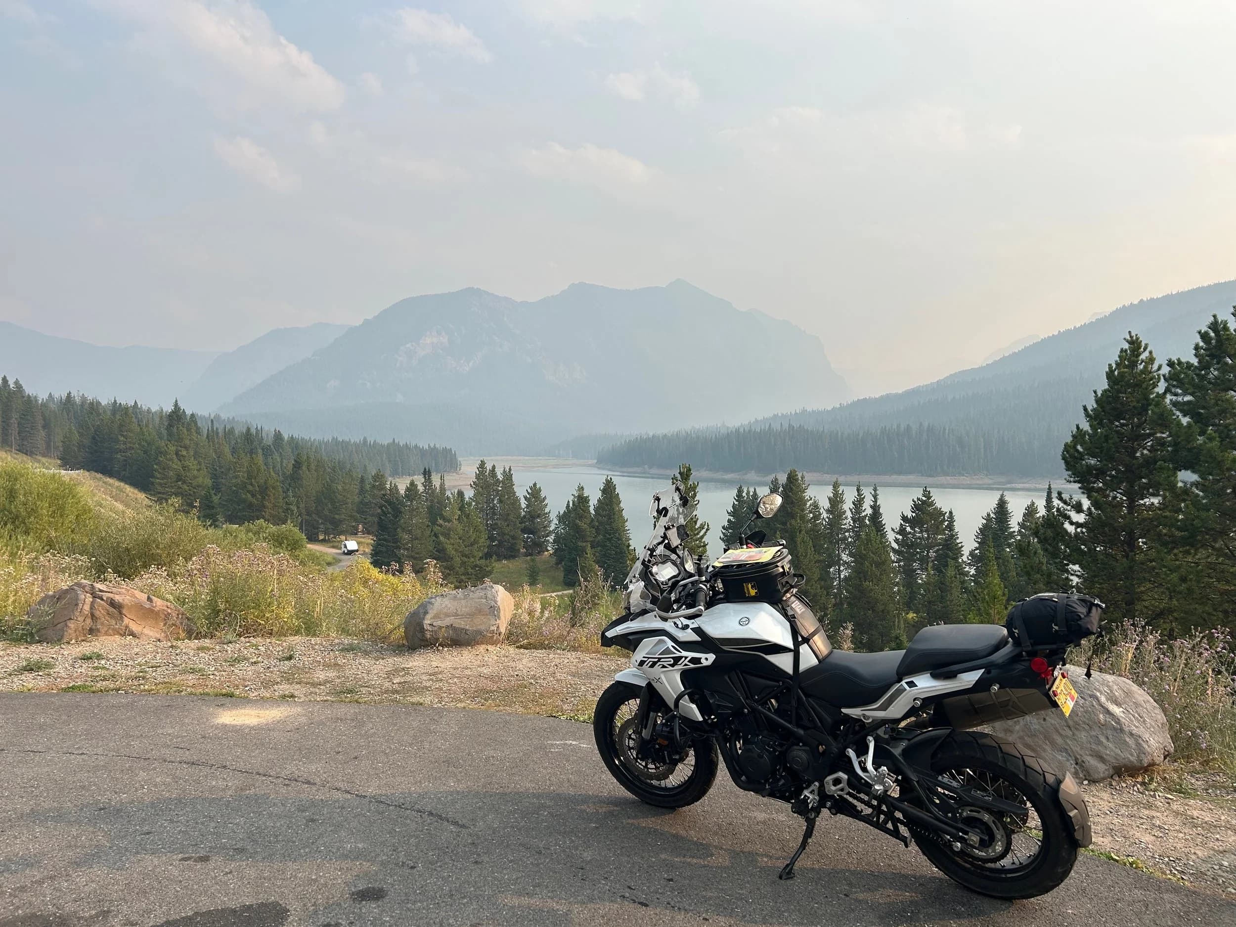 Trip Report: NW National Parks Loop
I left my job recently to take a much needed sabbatical and figure out what I’m doing next. A few weeks after my last day at work I embarked on what was to be a three week tour of NW-ish National Parks from Portland, to include Olympic, North Cascades, Glacier, Yellowstone, Grand Teton, Craters of the Moon, Lassen Volcanic, and Crater Lake.
I ended up missing Grand Tetons due to weather and I had to cut the trip short before I got to Lassen (family medical issue), so Lassen and Crater Lake remain unvisited.
Trip Dates: Sept 3 - Sept 16 (13 days)
Total Travel Miles: 3478 (does not include local miles for store runs, etc.)
Total Gallons of Gas Used: 82
Equipment: 2021 Benelli TRK502X Gaia GPS & Google Maps running on Sonim XP8 rugged Android phoneButler Motorcycle Maps (paper maps of best M/C roads in the country) iPhone 14 (main camera) Akaso Brave 7 helmet-mounted adventure camera Spot X satellite communicator and tracker Wolfman Luggage WP waterproof tank bag and saddle bags (no longer available) Watershed Colorado dry bag duffel (across the pillion seat) Kriega US-5 Drypack (tail bag) Kriega 3L hydration backpack (strapped to duffel, not worn)Marmot Ajax 2 tent Nemo hydrophobic down sleeping bag (non-mummy)Helinox ultralight cot MSR WhisperLite International stove
(Purchased in 1991 for my first moto trip: Detroit, MI to San Diego and back on an XT250)Gossamer Gear Bare Boxer bear-proof food canisters (two - one in each saddle bag)
Day 1 - Olympic National Park Date: Tuesday 9/3/2024
Destination: South Beach Campground, Olympic National Park
Travel Time: 4h 24m
Miles: 213Notes:
Planned to head west to Astoria then north from there, but left later than expected so headed up I-5 to US 12. I’ve driven/ridden that stretch of I-5 hundreds of times (starting in 1993). It’s boring and I hate it.
South Beach CG is first-come-first-served. I didn’t have issue getting a site. There is a long, tight loop of sites along the coastline, but I chose one of the sites further back near the bathrooms due to wind concerns. The bathroom building provided a sort of wind shelter for my site.
I used the heated grips on this leg; it was pretty chilly along the coast in the Olympic Peninsula. I almost didn’t install them, thinking I was being paranoid about the cold. I ended up using them a lot.
Day 2 - Ferry to Seattle / Burien Date: Wednesday 9/4/2024
Destination: Friend’s house in Burien, WA
Travel Time: 7h 30m
Miles: 199
Notes:
Slept well (thanks to Advil PM). I’ve not been sleeping well for more than a year. I’m really hoping to reset my sleep patterns with this trip. A good night’s sleep is one of my great joys and I feel like I’ve been robbed of that pleasure.
Used my Aeropress this morning for the first time ever. I’m hooked.
Headed up along US 101 through Port Angeles and then down to the Southworth ferry terminal near Port Orchard. Ferried across to Fauntleroy, which is just a few miles north my friend’s house in Burien. I’m always surprised at how long it takes to get from the Olympic Peninsula to the east side of Puget Sound (Seattle, etc.). With the ferry crossing (I love ferries) it took seven and a half hours to go 200 miles.
Discovered at my first stop of the day (just up 101 at the Kalaloch Campground, stopped to refill water) that the battery is quite weak and won’t start the bike if you leave the ignition on for even two minutes without the motor running. This would become a theme for the next few days. Fortunately, I have a jumper box and a permanent jump harness wired to the battery so jump starts are a quick operation.
Had a good evening with old friends.
Day 3 - North Cascades via Mountain Loop RoadDate: Thursday 9/5/2024
Destination: Newhalem Campground, North Cascades National Park
Travel Time: 4h 30m
Miles: 146Notes:
Slept well, on the couch. No pills needed.
I realized yesterday that my summer riding gloves (Rev’It Dune) were a size (or two) too small. Rev’It gloves fit really tight and I feel like I can never get it quite right. And yet, I love them. So, I stopped at a Cycle Gear in Bellevue to pick up something summer weight (Dirt 3) that fit better. They’re better, but maybe still one size too small. Such is life.
From Bellevue, I rode north and took the Mountain Loop Hwy then on up north to North Cascades. It was a hot ride. Still summer.
A small section of the Mountain Loop Road is dirt/gravel, which I didn’t realize. No biggie. Was just surprised (clearly I didn’t study my maps closely enough). When riding solo on a bike that weighs over 500 lbs., I tend to avoid planning much off-pavement riding. That’s what my DR-Z is for.
Day 4 - Newport, Washington via Winthrop Date: Friday 9/6/2024
Destination: Golden Spur Motor Inn, Newport, Washington
Travel Time: 8h
Miles: 308
Notes:
Slept just ok, even with Advil PM.
Pretty ride through North Cascades National Park and Colville National Forest. Didn’t do any backroads or hikes. Discovered (new to me) the town of Winthrop. Stopped for coffee at Sheri’s and resupplied on freeze-dried food at Cascades Outdoor Store.
The town of Newport is almost nothing, but, inexplicably, there’s an amazing restaurant (Brownell’s Place). Had dinner and a few ciders. Met and chatted with the owner/chef (she’s great). Listened to some live music. Then back to the motel.
Day 5 - New Battery in Kalispell Date: Saturday 9/7/2024
Destination: West Glacier KOA, West Glacier, MT
Travel Time: 8h 7m
Miles: 293
Notes:
Slept well on motel bed (on sleeping bag, not in the sheets). Another hot one.
Discovered that the water pump seal leaks oil. A quick post in the TRK Facebook group revealed that this is a common problem on this bike, and and easy fix. It’s apparently just a bad o-ring.
Battery has been getting continuously worse, and now requires I jump start the bike about every other start. Google Maps to the rescue: directions to the Batteries Plus in Kalispell, please. They don’t have an Odyssey AGM in the right size; the Duracell will have to do. (It’s been great.)
I set up camp at the West Glacier KOA, which will be my base for a few days. KOAs are their own little world. Very strange. Not really my thing, but the on-site laundry was handy.
After setting up camp I opened a cider and used the iPad to book a vehicle reservation for the next day to ride Going to the Sun Road, which I really wanted to do.
Day 6 - Going to the Sun RoadDate: Sunday 9/8/2024
Destination: Local Ride: West Glacier, Going to the Sun Road, Saint Mary, East Glacier
Travel Time: 5h 35m
Miles: 142Notes:
Quick breakfast and gas up in West Glacier before entering Going to the Sun Road.
Going to the Sun Road was stunning. This was the first point in the trip where I had tingles and was giddy at what I was seeing.
Took a very short hike along Saint Mary Lake. Again, I was beside myself with the beauty.
Lunch at the general store in Kiowa.
The rest of the ride back after East Glacier was meh, but I just kept thinking about how amazing what I’d seen in the morning had been.
Dinner at the KOA. Tacos from a cart (ok / not great, and a very weird guacamole) and a few glasses of wine from another cart. I asked about the guac and it turns out they make it in a food processor. Come on, people.
Day 7 - Ride to BozemanDate: Monday 9/9/2024
Destination: Friend’s house in Bozeman, Montana
Travel Time: ~ 8h (Gaia crashed near the end of the trip, but before getting to Bozeman)
Miles: ~ 400Notes:
Slept poorly again. No pills this time. Took some photos of my soft luggage setup to answer some questions in the TRK502X Facebook group. The saddle bags are from Wolfman Luggage, but I don’t think they make this waterproof line anymore. I use a duffel dry bag from Watershed across the top. A heat shield protects the side bag from exhaust heat.
Hazy, smoky ride most of the way. Very windy in places. This is where I first really started to feel how underpowered the TRK502 is. Really struggled in places.
Developed an engine-speed-sensitive squeak or rattle. Sounds like when a heat shield vibrates in resonance with engine vibration. Discovered that it’s a missing crash bar mounting bolt allowing the crash bar to rub against the frame.
Also noticed that there’s a resonant oscillation at speed that feels like the chain going bad (like it’s stretching unevenly).
First of several nights at a friend’s house in Bozeman (which, it turns out, is a pretty cool town). And there’s a hot tub…
Day 8 - Bike Maintenance & Hyalite ReservoirDate: Tuesday 9/10/2024
Destination: Local Ride: Hyalite Reservoir
Travel Time: not recorded
Miles: not recordedNotes:
Woke up to a smoky sunrise. I had the best night’s sleep I’ve had in years. This is was the whole point of this trip: to untangle my burnout and reclaim sleep as one of my joys. I wrote about it in my journal when I woke up. I hope this wasn’t a fluke.
Planned to replace the bolt that rattled loose from the crash bar, but instead discovered that it had actually severed off at the mount point. No fixing that on the road. Adjusted chain and moved on.
Lunch at Mountains Walking Brewery in Bozeman.
Rode up to Hyalite Reservoir. Pretty ride. Smoky still.
Soaked in hot tub after dinner.
Day 9 - North Yellowstone LoopDate: Wednesday 9/11/2024
Destination: Northern loop through Yellowstone National Park
Travel Time: 9h 36m
Miles: 272Notes:
Did a day trip from Bozeman down through the northern loop in Yellowstone, entering at Mammoth and taking the scenic route through Paradise Valley.
Saw elk, coyotes (I think), buffalo, and pronghorn.
Pretty ride, but cold in places. Used heated grips again.
Rode the loop through Mammoth Hot Springs (see video) at the end.
Coffee at Tumbleweed Bookstore & Cafe in Gardiner. I kind of dig Gardiner. Good vibe.
Had dinner at Mountains Walking Brewing. Rain and wind started. Lights flickered. Waited for rain to stop before riding back to the house.
Power out at the house due to high winds. This does not bode well for tomorrow.
Day 10 - Winter Weather in the ParksDate: Thursday 9/12/2024
Destination: Grand Teton National Park via West Yellowstone Pocatello, Idaho
Travel Time: 5h 40m
Miles: 201Notes:
Today was supposed to be a gorgeous ride through Yellowstone into Grand Teton National Park, and camping at Signal Mountain CG in the park. The weather had other ideas. It was pouring rain (and cold) all the way to West Yellowstone from Bozeman. By the time I got to West Yellowstone I was getting severe winter weather warnings on my phone calling for up to 3 (three!!) inches of snow accumulating in the high passes in the park. It’s bad enough in a car, but that’s a disaster waiting to happen on a motorcycle.
I parked my butt at Mountain Mama’s Cafe in West Yellowstone to warm up / dry off and decide what to do. I almost had myself convinced to push through when I realized that, even if I made it to the campground ok, I’d be setting up camp in the rain and I’d likely be miserable all night. Grand Teton would have to wait.
From West Yellowstone it’s easy to bail west into Idaho and get away from the park weather and elevations. So that’s what I did. It was not a pleasant ride, though. I was in torrential downpours all the way to Idaho Falls.
Arriving in Idaho Falls, I was exhausted and sure I could just find a room for the night. I dropped the bike at a roundabout (short-legged it coming to a stop; I knew it was going so I just rolled away). Guy behind me helped me pick it up. Then, there were no rooms because it was move in week for the two universities there (U of I, ISU). This would become a recurring theme.
I rode further to Blackfoot. Still no rooms.
I called ahead to Pocatello and got a room at a Red Lion there. I was never so happy to be off the bike.
No pictures this day. I couldn’t even get the action camera to turn on.
Day 11 - Craters of the Moon and EBR-1Date: Friday 9/13/2024
Destination: Craters of the Moon National Monument
Travel Time: 4h 20m
Miles: 124
Notes:
I wasn’t sure what my destination would be today but my plan was to do a little nuclear tourism, see Craters of the Moon, and then go somewhere from there. My schedule and day-plan was thrown off by missing Grand Teton National Park and spending a night in Pocatello, which was not on the itinerary at all.
Stopped in Atomic City. Not sure why; I was under the impression that Atomic City was the first city lit by nuclear engergy, but it was practically a ghost town. There are a few houses there, but as far as I could tell all of the business were shuttered. Except, maybe, for the race track; that looked like it might still get used.
Arco, it turns out, is the city celebrated as the first in the world to be lit by nuclear energy. Nothing special about the town, but they do a nice job of making City Hall photo-worthy.
Between Atomic City and Arco is EBR-1 (Experimental Breeder Reactor I) which was the world’s first breeder reactor. The EBR-1 exhibit was closed for the season, but in the lot next to it were some really interesting experimental nuclear heat-transfer jet engines that never made it out of the experimental phase (probably a good thing).
Craters of the Moon is pretty small. If you don’t do any of the walks, it’s literally just a 30 minute road loop. Still, it was an unexpected surprise and delight. I had no idea what to expect but I was positively chuffed at the experience. I noticed that the campground had open sites so I inquired at the entry booth. As luck would have it, the whole campground is first come / first serve. I decided to set up for the night. It’s good to be done early and have some time to read and not stress about making distance.
Day 12 - New Chain in Twin FallsDate: Saturday 9/14/2024
Destination: Battle Mountain, Nevada
Travel Time: 8h 52m
Miles: 335
Notes:
Beautiful morning in Craters of the Moon. While I was breaking camp a parade of classic cars came into the park to drive the loop. I got a picture of one Pontiac down the road in Carey at a gas station.
Carey ended up being an unplanned fork in the road for me. I discovered this morning that my chain was indeed stretching unevenly, and the oscillation I was feeling and hearing was the chain hum changing from a “loose” hum to a “tight” hum rapidly as the tight spot moved around the sprockets. I was supposed to continue west to Mountain Home and then south from there into Nevada. A very scenic route, according to my Butler map. But, between camp and the gas station I got pretty paranoid about the chain snapping at high speed, which, worst case, could lead to a fatal crash.
So I called ahead to a few motorcycle dealers in Mountain Home (on my planned route) to see if they could take me in and replace the chain. No dice. This is the downside of having an obscure motorcycle from an obscure marque - no one wants to work on it. Making matters worse this is an Italian-designed bike built in China, a fact which causes many people to lose the ability to think clearly. “It’s Chinese junk!” Not so. Next.
With Mountain Home out, I tried Twin Falls. My first call was to Adventure Motorsports, and the service manager there took me in with no hesitation. “How soon can you be here?” I didn’t get his name, but my hat’s off to him and his one tech working furiously on a Saturday to beat the 3pm closing time. He said during high season, they get about 15-20 out of town travelers per week who need something done, and they take them all in. I love to hear stuff like this. This shop is in it for the community. They have a nice showroom, too.
With a quality new chain installed, I got a burrito and a MexiCoke at a Mexican place and went on my way. I made it to Battle Mountain, NV, where I decide to get a room. Tomorrow I rejoin my planned scenic route. Day 13 - Desert Mountains in NV, CADate: Sunday 9/15/2024
Destination: Grizzly Campground, Lake Davis (near Portola, CA)
Travel Time: 7h
Miles: 307
Notes:
I love the northern Nevada landscape, and today’s ride didn’t disappoint. US Highway 50 is apparently known as “The Loneliest Highway” but everyone knows about it, so it’s not very lonely. However, after leaving Austin, NV headed west you can take Nevada Highway 722, which dips to the south and follows the old US 50 route. It was completely empty and the twisties through the passes were fun. Highly recommended.
Stopped in Fallon for gas and to find a Micro SD card for the action camera. Walmart to the rescue.
After Reno, I crossed into California and, I swear, it looks different. Norther California desert mountains are so beautiful.
Camped at a nearly empty campground on Lake Davis (very end of the season). The host warned me rain was coming tomorrow.
Day 14 - Unplanned Return HomeDate: Monday 9/16/2024
Destination: Summit Lake Campground, Lassen Volcanic National Park Portland, Oregon (Home)
Travel Time: 10h 32m
Miles: 538Notes:
Last week, my mom went into the hospital for a fairly routine procedure. My brother went to Michigan to help out, as needed, and he went back home to Arizona after she returned home and everything seemed settled.
This morning, while having coffee, I got a call that she’d gone back into the hospital with something that may or may not have been related to the procedure. It seemed like maybe things were ok, but maybe not.
I decided the best thing to do was head home so that I was near an airport if I needed to fly out to Michigan to help out.
I packed up camp and headed up US 395 toward home, via Klamath Falls. It was a pretty ride, but, once again, I found myself in rain most of the way to Klamath Falls.
I was pretty beat by the time I got to Klamath Falls and figured I’d just find a hotel room, get a hot shower, and finish the ride tomorrow.
But, once again, it was move-in week for the local university. Holiday Inn Express had a single room for $395. No thanks. Onward.
I never hit rain again after Klamath Falls, and after turning west onto Oregon Hwy 58 and starting to lose elevation into the Willamette Valley, the temperature starting rising, which was welcome.
Once I reached Eugene, there was no point in not just going all the way home, so that’s what I did.
I got two pictures: one at camp before the call, and one at my last gas stop, an hour and twenty minutes from home, with the moon rising.
A nice side effect of my early return home is that I was home for my birthday (tomorrow), so I had dinner with my kids and my wife, which was lovely.
I did end up flying to Michigan the next day, and was there for a bit. The best part? I got to make some meals for my mom and step dad. Everything seems ok with my mom for now.
Grand Teton, Lassen, and Crater Lake will be there, and now I have an excuse for another trip in the future.