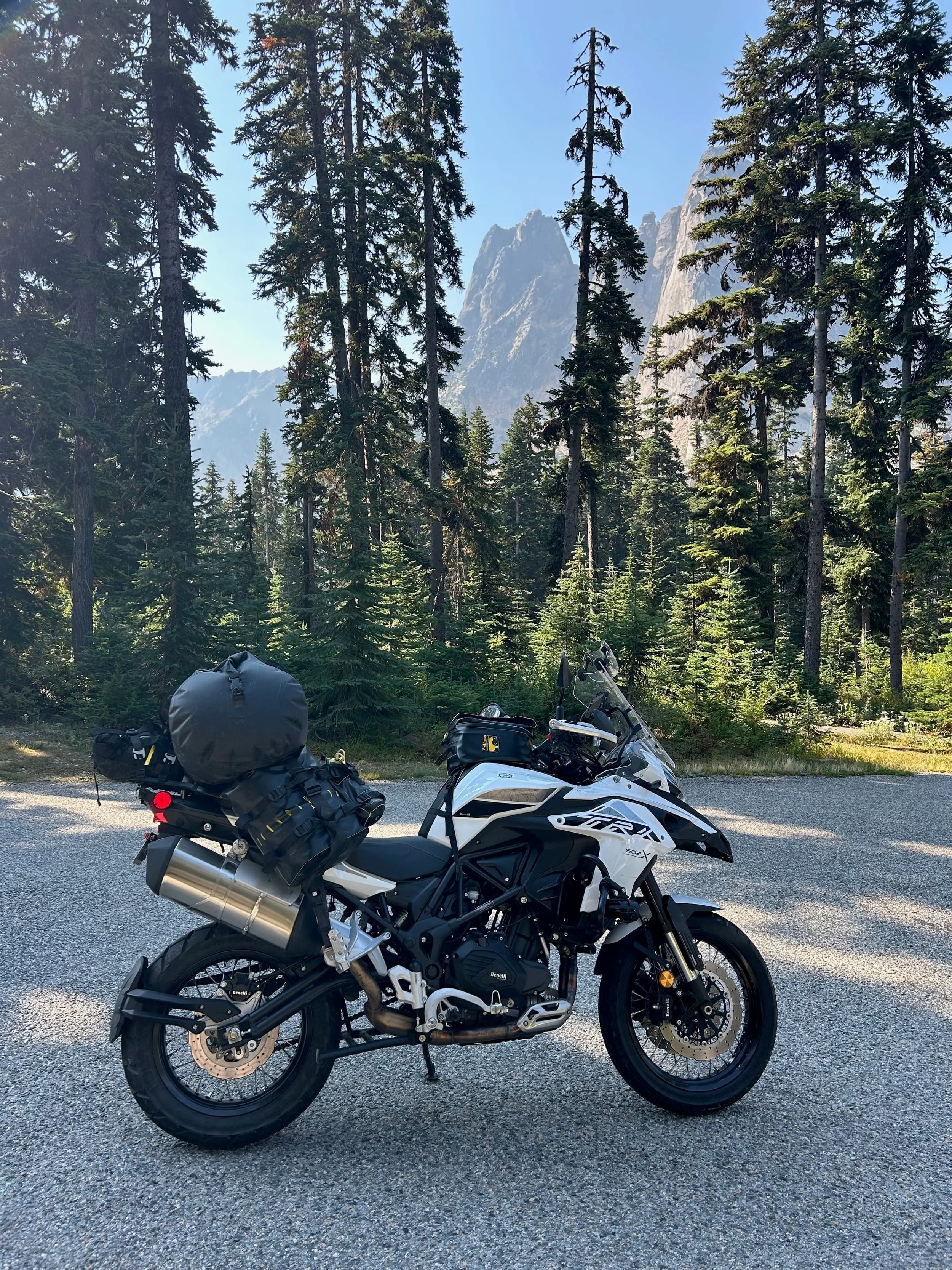Trip Report: NW National Parks Loop
I left my job recently to take a much needed sabbatical and figure out what I’m doing next. A few weeks after my last day at work I embarked on what was to be a three week tour of NW-ish National Parks from Portland, to include Olympic, North Cascades, Glacier, Yellowstone, Grand Teton, Craters of the Moon, Lassen Volcanic, and Crater Lake.
I ended up missing Grand Tetons due to weather and I had to cut the trip short before I got to Lassen (family medical issue), so Lassen and Crater Lake remain unvisited.
Trip Dates: Sept 3 - Sept 16 (13 days)
Total Travel Miles: 3478 (does not include local miles for store runs, etc.)
Total Gallons of Gas Used: 82
Equipment: 2021 Benelli TRK502X Gaia GPS & Google Maps running on Sonim XP8 rugged Android phoneButler Motorcycle Maps (paper maps of best M/C roads in the country) iPhone 14 (main camera) Akaso Brave 7 helmet-mounted adventure camera Spot X satellite communicator and tracker Wolfman Luggage WP waterproof tank bag and saddle bags (no longer available) Watershed Colorado dry bag duffel (across the pillion seat) Kriega US-5 Drypack (tail bag) Kriega 3L hydration backpack (strapped to duffel, not worn)Marmot Ajax 2 tent Nemo hydrophobic down sleeping bag (non-mummy)Helinox ultralight cot MSR WhisperLite International stove
(Purchased in 1991 for my first moto trip: Detroit, MI to San Diego and back on an XT250)Gossamer Gear Bare Boxer bear-proof food canisters (two - one in each saddle bag)
Day 1 - Olympic National Park Date: Tuesday 9/3/2024
Destination: South Beach Campground, Olympic National Park
Travel Time: 4h 24m
Miles: 213Notes:
Planned to head west to Astoria then north from there, but left later than expected so headed up I-5 to US 12. I’ve driven/ridden that stretch of I-5 hundreds of times (starting in 1993). It’s boring and I hate it.
South Beach CG is first-come-first-served. I didn’t have issue getting a site. There is a long, tight loop of sites along the coastline, but I chose one of the sites further back near the bathrooms due to wind concerns. The bathroom building provided a sort of wind shelter for my site.
I used the heated grips on this leg; it was pretty chilly along the coast in the Olympic Peninsula. I almost didn’t install them, thinking I was being paranoid about the cold. I ended up using them a lot.
Day 2 - Ferry to Seattle / Burien Date: Wednesday 9/4/2024
Destination: Friend’s house in Burien, WA
Travel Time: 7h 30m
Miles: 199
Notes:
Slept well (thanks to Advil PM). I’ve not been sleeping well for more than a year. I’m really hoping to reset my sleep patterns with this trip. A good night’s sleep is one of my great joys and I feel like I’ve been robbed of that pleasure.
Used my Aeropress this morning for the first time ever. I’m hooked.
Headed up along US 101 through Port Angeles and then down to the Southworth ferry terminal near Port Orchard. Ferried across to Fauntleroy, which is just a few miles north my friend’s house in Burien. I’m always surprised at how long it takes to get from the Olympic Peninsula to the east side of Puget Sound (Seattle, etc.). With the ferry crossing (I love ferries) it took seven and a half hours to go 200 miles.
Discovered at my first stop of the day (just up 101 at the Kalaloch Campground, stopped to refill water) that the battery is quite weak and won’t start the bike if you leave the ignition on for even two minutes without the motor running. This would become a theme for the next few days. Fortunately, I have a jumper box and a permanent jump harness wired to the battery so jump starts are a quick operation.
Had a good evening with old friends.
Day 3 - North Cascades via Mountain Loop RoadDate: Thursday 9/5/2024
Destination: Newhalem Campground, North Cascades National Park
Travel Time: 4h 30m
Miles: 146Notes:
Slept well, on the couch. No pills needed.
I realized yesterday that my summer riding gloves (Rev’It Dune) were a size (or two) too small. Rev’It gloves fit really tight and I feel like I can never get it quite right. And yet, I love them. So, I stopped at a Cycle Gear in Bellevue to pick up something summer weight (Dirt 3) that fit better. They’re better, but maybe still one size too small. Such is life.
From Bellevue, I rode north and took the Mountain Loop Hwy then on up north to North Cascades. It was a hot ride. Still summer.
A small section of the Mountain Loop Road is dirt/gravel, which I didn’t realize. No biggie. Was just surprised (clearly I didn’t study my maps closely enough). When riding solo on a bike that weighs over 500 lbs., I tend to avoid planning much off-pavement riding. That’s what my DR-Z is for.
Day 4 - Newport, Washington via Winthrop Date: Friday 9/6/2024
Destination: Golden Spur Motor Inn, Newport, Washington
Travel Time: 8h
Miles: 308
Notes:
Slept just ok, even with Advil PM.
Pretty ride through North Cascades National Park and Colville National Forest. Didn’t do any backroads or hikes. Discovered (new to me) the town of Winthrop. Stopped for coffee at Sheri’s and resupplied on freeze-dried food at Cascades Outdoor Store.
The town of Newport is almost nothing, but, inexplicably, there’s an amazing restaurant (Brownell’s Place). Had dinner and a few ciders. Met and chatted with the owner/chef (she’s great). Listened to some live music. Then back to the motel.
Day 5 - New Battery in Kalispell Date: Saturday 9/7/2024
Destination: West Glacier KOA, West Glacier, MT
Travel Time: 8h 7m
Miles: 293
Notes:
Slept well on motel bed (on sleeping bag, not in the sheets). Another hot one.
Discovered that the water pump seal leaks oil. A quick post in the TRK Facebook group revealed that this is a common problem on this bike, and and easy fix. It’s apparently just a bad o-ring.
Battery has been getting continuously worse, and now requires I jump start the bike about every other start. Google Maps to the rescue: directions to the Batteries Plus in Kalispell, please. They don’t have an Odyssey AGM in the right size; the Duracell will have to do. (It’s been great.)
I set up camp at the West Glacier KOA, which will be my base for a few days. KOAs are their own little world. Very strange. Not really my thing, but the on-site laundry was handy.
After setting up camp I opened a cider and used the iPad to book a vehicle reservation for the next day to ride Going to the Sun Road, which I really wanted to do.
Day 6 - Going to the Sun RoadDate: Sunday 9/8/2024
Destination: Local Ride: West Glacier, Going to the Sun Road, Saint Mary, East Glacier
Travel Time: 5h 35m
Miles: 142Notes:
Quick breakfast and gas up in West Glacier before entering Going to the Sun Road.
Going to the Sun Road was stunning. This was the first point in the trip where I had tingles and was giddy at what I was seeing.
Took a very short hike along Saint Mary Lake. Again, I was beside myself with the beauty.
Lunch at the general store in Kiowa.
The rest of the ride back after East Glacier was meh, but I just kept thinking about how amazing what I’d seen in the morning had been.
Dinner at the KOA. Tacos from a cart (ok / not great, and a very weird guacamole) and a few glasses of wine from another cart. I asked about the guac and it turns out they make it in a food processor. Come on, people.
Day 7 - Ride to BozemanDate: Monday 9/9/2024
Destination: Friend’s house in Bozeman, Montana
Travel Time: ~ 8h (Gaia crashed near the end of the trip, but before getting to Bozeman)
Miles: ~ 400Notes:
Slept poorly again. No pills this time. Took some photos of my soft luggage setup to answer some questions in the TRK502X Facebook group. The saddle bags are from Wolfman Luggage, but I don’t think they make this waterproof line anymore. I use a duffel dry bag from Watershed across the top. A heat shield protects the side bag from exhaust heat.
Hazy, smoky ride most of the way. Very windy in places. This is where I first really started to feel how underpowered the TRK502 is. Really struggled in places.
Developed an engine-speed-sensitive squeak or rattle. Sounds like when a heat shield vibrates in resonance with engine vibration. Discovered that it’s a missing crash bar mounting bolt allowing the crash bar to rub against the frame.
Also noticed that there’s a resonant oscillation at speed that feels like the chain going bad (like it’s stretching unevenly).
First of several nights at a friend’s house in Bozeman (which, it turns out, is a pretty cool town). And there’s a hot tub…
Day 8 - Bike Maintenance & Hyalite ReservoirDate: Tuesday 9/10/2024
Destination: Local Ride: Hyalite Reservoir
Travel Time: not recorded
Miles: not recordedNotes:
Woke up to a smoky sunrise. I had the best night’s sleep I’ve had in years. This is was the whole point of this trip: to untangle my burnout and reclaim sleep as one of my joys. I wrote about it in my journal when I woke up. I hope this wasn’t a fluke.
Planned to replace the bolt that rattled loose from the crash bar, but instead discovered that it had actually severed off at the mount point. No fixing that on the road. Adjusted chain and moved on.
Lunch at Mountains Walking Brewery in Bozeman.
Rode up to Hyalite Reservoir. Pretty ride. Smoky still.
Soaked in hot tub after dinner.
Day 9 - North Yellowstone LoopDate: Wednesday 9/11/2024
Destination: Northern loop through Yellowstone National Park
Travel Time: 9h 36m
Miles: 272Notes:
Did a day trip from Bozeman down through the northern loop in Yellowstone, entering at Mammoth and taking the scenic route through Paradise Valley.
Saw elk, coyotes (I think), buffalo, and pronghorn.
Pretty ride, but cold in places. Used heated grips again.
Rode the loop through Mammoth Hot Springs (see video) at the end.
Coffee at Tumbleweed Bookstore & Cafe in Gardiner. I kind of dig Gardiner. Good vibe.
Had dinner at Mountains Walking Brewing. Rain and wind started. Lights flickered. Waited for rain to stop before riding back to the house.
Power out at the house due to high winds. This does not bode well for tomorrow.
Day 10 - Winter Weather in the ParksDate: Thursday 9/12/2024
Destination: Grand Teton National Park via West Yellowstone Pocatello, Idaho
Travel Time: 5h 40m
Miles: 201Notes:
Today was supposed to be a gorgeous ride through Yellowstone into Grand Teton National Park, and camping at Signal Mountain CG in the park. The weather had other ideas. It was pouring rain (and cold) all the way to West Yellowstone from Bozeman. By the time I got to West Yellowstone I was getting severe winter weather warnings on my phone calling for up to 3 (three!!) inches of snow accumulating in the high passes in the park. It’s bad enough in a car, but that’s a disaster waiting to happen on a motorcycle.
I parked my butt at Mountain Mama’s Cafe in West Yellowstone to warm up / dry off and decide what to do. I almost had myself convinced to push through when I realized that, even if I made it to the campground ok, I’d be setting up camp in the rain and I’d likely be miserable all night. Grand Teton would have to wait.
From West Yellowstone it’s easy to bail west into Idaho and get away from the park weather and elevations. So that’s what I did. It was not a pleasant ride, though. I was in torrential downpours all the way to Idaho Falls.
Arriving in Idaho Falls, I was exhausted and sure I could just find a room for the night. I dropped the bike at a roundabout (short-legged it coming to a stop; I knew it was going so I just rolled away). Guy behind me helped me pick it up. Then, there were no rooms because it was move in week for the two universities there (U of I, ISU). This would become a recurring theme.
I rode further to Blackfoot. Still no rooms.
I called ahead to Pocatello and got a room at a Red Lion there. I was never so happy to be off the bike.
No pictures this day. I couldn’t even get the action camera to turn on.
Day 11 - Craters of the Moon and EBR-1Date: Friday 9/13/2024
Destination: Craters of the Moon National Monument
Travel Time: 4h 20m
Miles: 124
Notes:
I wasn’t sure what my destination would be today but my plan was to do a little nuclear tourism, see Craters of the Moon, and then go somewhere from there. My schedule and day-plan was thrown off by missing Grand Teton National Park and spending a night in Pocatello, which was not on the itinerary at all.
Stopped in Atomic City. Not sure why; I was under the impression that Atomic City was the first city lit by nuclear engergy, but it was practically a ghost town. There are a few houses there, but as far as I could tell all of the business were shuttered. Except, maybe, for the race track; that looked like it might still get used.
Arco, it turns out, is the city celebrated as the first in the world to be lit by nuclear energy. Nothing special about the town, but they do a nice job of making City Hall photo-worthy.
Between Atomic City and Arco is EBR-1 (Experimental Breeder Reactor I) which was the world’s first breeder reactor. The EBR-1 exhibit was closed for the season, but in the lot next to it were some really interesting experimental nuclear heat-transfer jet engines that never made it out of the experimental phase (probably a good thing).
Craters of the Moon is pretty small. If you don’t do any of the walks, it’s literally just a 30 minute road loop. Still, it was an unexpected surprise and delight. I had no idea what to expect but I was positively chuffed at the experience. I noticed that the campground had open sites so I inquired at the entry booth. As luck would have it, the whole campground is first come / first serve. I decided to set up for the night. It’s good to be done early and have some time to read and not stress about making distance.
Day 12 - New Chain in Twin FallsDate: Saturday 9/14/2024
Destination: Battle Mountain, Nevada
Travel Time: 8h 52m
Miles: 335
Notes:
Beautiful morning in Craters of the Moon. While I was breaking camp a parade of classic cars came into the park to drive the loop. I got a picture of one Pontiac down the road in Carey at a gas station.
Carey ended up being an unplanned fork in the road for me. I discovered this morning that my chain was indeed stretching unevenly, and the oscillation I was feeling and hearing was the chain hum changing from a “loose” hum to a “tight” hum rapidly as the tight spot moved around the sprockets. I was supposed to continue west to Mountain Home and then south from there into Nevada. A very scenic route, according to my Butler map. But, between camp and the gas station I got pretty paranoid about the chain snapping at high speed, which, worst case, could lead to a fatal crash.
So I called ahead to a few motorcycle dealers in Mountain Home (on my planned route) to see if they could take me in and replace the chain. No dice. This is the downside of having an obscure motorcycle from an obscure marque - no one wants to work on it. Making matters worse this is an Italian-designed bike built in China, a fact which causes many people to lose the ability to think clearly. “It’s Chinese junk!” Not so. Next.
With Mountain Home out, I tried Twin Falls. My first call was to Adventure Motorsports, and the service manager there took me in with no hesitation. “How soon can you be here?” I didn’t get his name, but my hat’s off to him and his one tech working furiously on a Saturday to beat the 3pm closing time. He said during high season, they get about 15-20 out of town travelers per week who need something done, and they take them all in. I love to hear stuff like this. This shop is in it for the community. They have a nice showroom, too.
With a quality new chain installed, I got a burrito and a MexiCoke at a Mexican place and went on my way. I made it to Battle Mountain, NV, where I decide to get a room. Tomorrow I rejoin my planned scenic route. Day 13 - Desert Mountains in NV, CADate: Sunday 9/15/2024
Destination: Grizzly Campground, Lake Davis (near Portola, CA)
Travel Time: 7h
Miles: 307
Notes:
I love the northern Nevada landscape, and today’s ride didn’t disappoint. US Highway 50 is apparently known as “The Loneliest Highway” but everyone knows about it, so it’s not very lonely. However, after leaving Austin, NV headed west you can take Nevada Highway 722, which dips to the south and follows the old US 50 route. It was completely empty and the twisties through the passes were fun. Highly recommended.
Stopped in Fallon for gas and to find a Micro SD card for the action camera. Walmart to the rescue.
After Reno, I crossed into California and, I swear, it looks different. Norther California desert mountains are so beautiful.
Camped at a nearly empty campground on Lake Davis (very end of the season). The host warned me rain was coming tomorrow.
Day 14 - Unplanned Return HomeDate: Monday 9/16/2024
Destination: Summit Lake Campground, Lassen Volcanic National Park Portland, Oregon (Home)
Travel Time: 10h 32m
Miles: 538Notes:
Last week, my mom went into the hospital for a fairly routine procedure. My brother went to Michigan to help out, as needed, and he went back home to Arizona after she returned home and everything seemed settled.
This morning, while having coffee, I got a call that she’d gone back into the hospital with something that may or may not have been related to the procedure. It seemed like maybe things were ok, but maybe not.
I decided the best thing to do was head home so that I was near an airport if I needed to fly out to Michigan to help out.
I packed up camp and headed up US 395 toward home, via Klamath Falls. It was a pretty ride, but, once again, I found myself in rain most of the way to Klamath Falls.
I was pretty beat by the time I got to Klamath Falls and figured I’d just find a hotel room, get a hot shower, and finish the ride tomorrow.
But, once again, it was move-in week for the local university. Holiday Inn Express had a single room for $395. No thanks. Onward.
I never hit rain again after Klamath Falls, and after turning west onto Oregon Hwy 58 and starting to lose elevation into the Willamette Valley, the temperature starting rising, which was welcome.
Once I reached Eugene, there was no point in not just going all the way home, so that’s what I did.
I got two pictures: one at camp before the call, and one at my last gas stop, an hour and twenty minutes from home, with the moon rising.
A nice side effect of my early return home is that I was home for my birthday (tomorrow), so I had dinner with my kids and my wife, which was lovely.
I did end up flying to Michigan the next day, and was there for a bit. The best part? I got to make some meals for my mom and step dad. Everything seems ok with my mom for now.
Grand Teton, Lassen, and Crater Lake will be there, and now I have an excuse for another trip in the future.