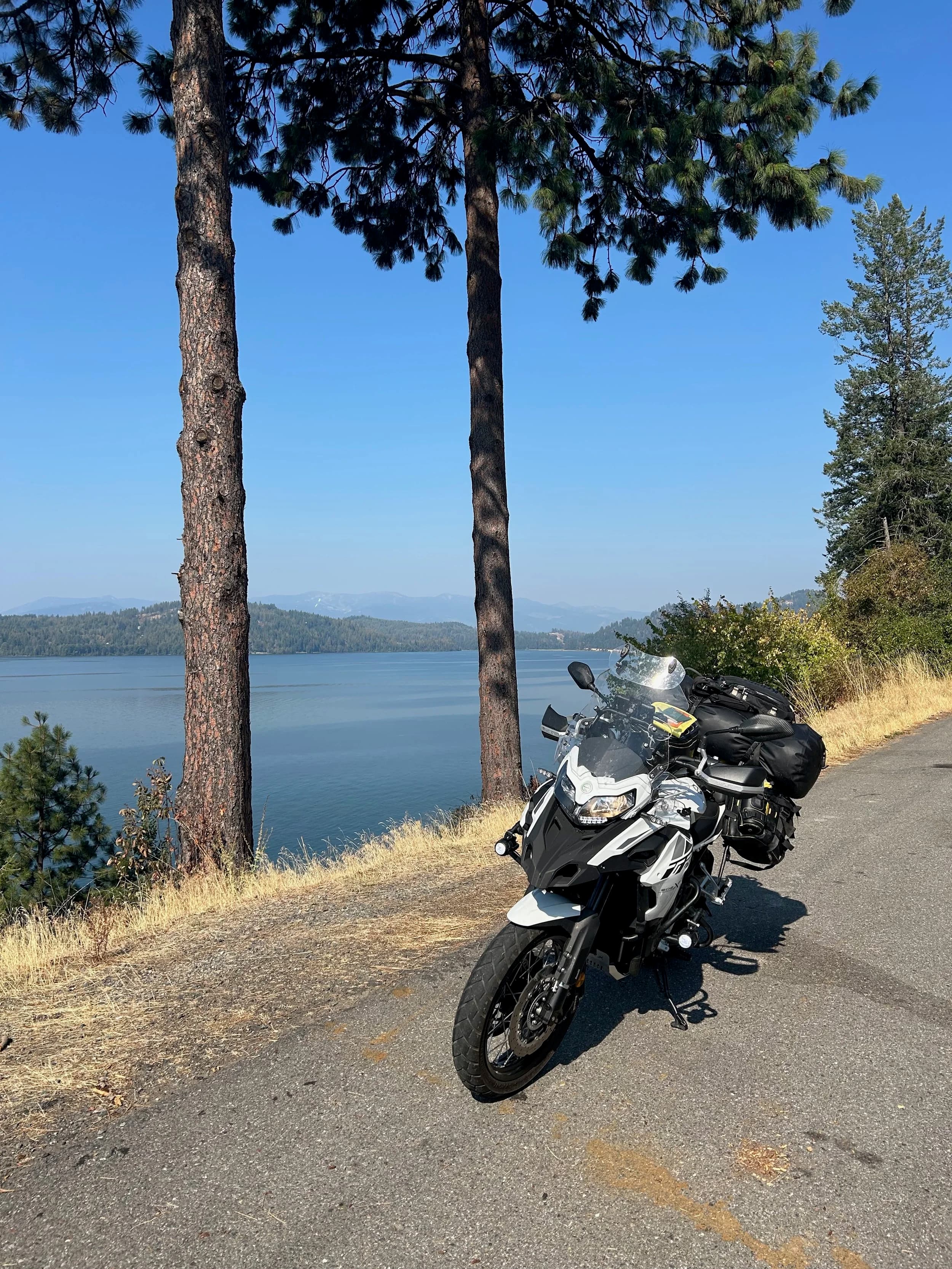 Trip Report: NW National Parks Loop
I left my job recently to take a much needed sabbatical and figure out what I’m doing next. A few weeks after my last day at work I embarked on what was to be a three week tour of NW-ish National Parks from Portland, to include Olympic, North Cascades, Glacier, Yellowstone, Grand Teton, Craters of the Moon, Lassen Volcanic, and Crater Lake.
I ended up missing Grand Tetons due to weather and I had to cut the trip short before I got to Lassen (family medical issue), so Lassen and Crater Lake remain unvisited.
Trip Dates: Sept 3 - Sept 16 (13 days)
Total Travel Miles: 3478 (does not include local miles for store runs, etc.)
Total Gallons of Gas Used: 82
Equipment: 2021 Benelli TRK502X Gaia GPS & Google Maps running on Sonim XP8 rugged Android phoneButler Motorcycle Maps (paper maps of best M/C roads in the country) iPhone 14 (main camera) Akaso Brave 7 helmet-mounted adventure camera Spot X satellite communicator and tracker Wolfman Luggage WP waterproof tank bag and saddle bags (no longer available) Watershed Colorado dry bag duffel (across the pillion seat) Kriega US-5 Drypack (tail bag) Kriega 3L hydration backpack (strapped to duffel, not worn)Marmot Ajax 2 tent Nemo hydrophobic down sleeping bag (non-mummy)Helinox ultralight cot MSR WhisperLite International stove
(Purchased in 1991 for my first moto trip: Detroit, MI to San Diego and back on an XT250)Gossamer Gear Bare Boxer bear-proof food canisters (two - one in each saddle bag)
Day 1 - Olympic National Park Date: Tuesday 9/3/2024
Destination: South Beach Campground, Olympic National Park
Travel Time: 4h 24m
Miles: 213Notes:
Planned to head west to Astoria then north from there, but left later than expected so headed up I-5 to US 12. I’ve driven/ridden that stretch of I-5 hundreds of times (starting in 1993). It’s boring and I hate it.
South Beach CG is first-come-first-served. I didn’t have issue getting a site. There is a long, tight loop of sites along the coastline, but I chose one of the sites further back near the bathrooms due to wind concerns. The bathroom building provided a sort of wind shelter for my site.
I used the heated grips on this leg; it was pretty chilly along the coast in the Olympic Peninsula. I almost didn’t install them, thinking I was being paranoid about the cold. I ended up using them a lot.
Day 2 - Ferry to Seattle / Burien Date: Wednesday 9/4/2024
Destination: Friend’s house in Burien, WA
Travel Time: 7h 30m
Miles: 199
Notes:
Slept well (thanks to Advil PM). I’ve not been sleeping well for more than a year. I’m really hoping to reset my sleep patterns with this trip. A good night’s sleep is one of my great joys and I feel like I’ve been robbed of that pleasure.
Used my Aeropress this morning for the first time ever. I’m hooked.
Headed up along US 101 through Port Angeles and then down to the Southworth ferry terminal near Port Orchard. Ferried across to Fauntleroy, which is just a few miles north my friend’s house in Burien. I’m always surprised at how long it takes to get from the Olympic Peninsula to the east side of Puget Sound (Seattle, etc.). With the ferry crossing (I love ferries) it took seven and a half hours to go 200 miles.
Discovered at my first stop of the day (just up 101 at the Kalaloch Campground, stopped to refill water) that the battery is quite weak and won’t start the bike if you leave the ignition on for even two minutes without the motor running. This would become a theme for the next few days. Fortunately, I have a jumper box and a permanent jump harness wired to the battery so jump starts are a quick operation.
Had a good evening with old friends.
Day 3 - North Cascades via Mountain Loop RoadDate: Thursday 9/5/2024
Destination: Newhalem Campground, North Cascades National Park
Travel Time: 4h 30m
Miles: 146Notes:
Slept well, on the couch. No pills needed.
I realized yesterday that my summer riding gloves (Rev’It Dune) were a size (or two) too small. Rev’It gloves fit really tight and I feel like I can never get it quite right. And yet, I love them. So, I stopped at a Cycle Gear in Bellevue to pick up something summer weight (Dirt 3) that fit better. They’re better, but maybe still one size too small. Such is life.
From Bellevue, I rode north and took the Mountain Loop Hwy then on up north to North Cascades. It was a hot ride. Still summer.
A small section of the Mountain Loop Road is dirt/gravel, which I didn’t realize. No biggie. Was just surprised (clearly I didn’t study my maps closely enough). When riding solo on a bike that weighs over 500 lbs., I tend to avoid planning much off-pavement riding. That’s what my DR-Z is for.
Day 4 - Newport, Washington via Winthrop Date: Friday 9/6/2024
Destination: Golden Spur Motor Inn, Newport, Washington
Travel Time: 8h
Miles: 308
Notes:
Slept just ok, even with Advil PM.
Pretty ride through North Cascades National Park and Colville National Forest. Didn’t do any backroads or hikes. Discovered (new to me) the town of Winthrop. Stopped for coffee at Sheri’s and resupplied on freeze-dried food at Cascades Outdoor Store.
The town of Newport is almost nothing, but, inexplicably, there’s an amazing restaurant (Brownell’s Place). Had dinner and a few ciders. Met and chatted with the owner/chef (she’s great). Listened to some live music. Then back to the motel.
Day 5 - New Battery in Kalispell Date: Saturday 9/7/2024
Destination: West Glacier KOA, West Glacier, MT
Travel Time: 8h 7m
Miles: 293
Notes:
Slept well on motel bed (on sleeping bag, not in the sheets). Another hot one.
Discovered that the water pump seal leaks oil. A quick post in the TRK Facebook group revealed that this is a common problem on this bike, and and easy fix. It’s apparently just a bad o-ring.
Battery has been getting continuously worse, and now requires I jump start the bike about every other start. Google Maps to the rescue: directions to the Batteries Plus in Kalispell, please. They don’t have an Odyssey AGM in the right size; the Duracell will have to do. (It’s been great.)
I set up camp at the West Glacier KOA, which will be my base for a few days. KOAs are their own little world. Very strange. Not really my thing, but the on-site laundry was handy.
After setting up camp I opened a cider and used the iPad to book a vehicle reservation for the next day to ride Going to the Sun Road, which I really wanted to do.
Day 6 - Going to the Sun RoadDate: Sunday 9/8/2024
Destination: Local Ride: West Glacier, Going to the Sun Road, Saint Mary, East Glacier
Travel Time: 5h 35m
Miles: 142Notes:
Quick breakfast and gas up in West Glacier before entering Going to the Sun Road.
Going to the Sun Road was stunning. This was the first point in the trip where I had tingles and was giddy at what I was seeing.
Took a very short hike along Saint Mary Lake. Again, I was beside myself with the beauty.
Lunch at the general store in Kiowa.
The rest of the ride back after East Glacier was meh, but I just kept thinking about how amazing what I’d seen in the morning had been.
Dinner at the KOA. Tacos from a cart (ok / not great, and a very weird guacamole) and a few glasses of wine from another cart. I asked about the guac and it turns out they make it in a food processor. Come on, people.
Day 7 - Ride to BozemanDate: Monday 9/9/2024
Destination: Friend’s house in Bozeman, Montana
Travel Time: ~ 8h (Gaia crashed near the end of the trip, but before getting to Bozeman)
Miles: ~ 400Notes:
Slept poorly again. No pills this time. Took some photos of my soft luggage setup to answer some questions in the TRK502X Facebook group. The saddle bags are from Wolfman Luggage, but I don’t think they make this waterproof line anymore. I use a duffel dry bag from Watershed across the top. A heat shield protects the side bag from exhaust heat.
Hazy, smoky ride most of the way. Very windy in places. This is where I first really started to feel how underpowered the TRK502 is. Really struggled in places.
Developed an engine-speed-sensitive squeak or rattle. Sounds like when a heat shield vibrates in resonance with engine vibration. Discovered that it’s a missing crash bar mounting bolt allowing the crash bar to rub against the frame.
Also noticed that there’s a resonant oscillation at speed that feels like the chain going bad (like it’s stretching unevenly).
First of several nights at a friend’s house in Bozeman (which, it turns out, is a pretty cool town). And there’s a hot tub…
Day 8 - Bike Maintenance & Hyalite ReservoirDate: Tuesday 9/10/2024
Destination: Local Ride: Hyalite Reservoir
Travel Time: not recorded
Miles: not recordedNotes:
Woke up to a smoky sunrise. I had the best night’s sleep I’ve had in years. This is was the whole point of this trip: to untangle my burnout and reclaim sleep as one of my joys. I wrote about it in my journal when I woke up. I hope this wasn’t a fluke.
Planned to replace the bolt that rattled loose from the crash bar, but instead discovered that it had actually severed off at the mount point. No fixing that on the road. Adjusted chain and moved on.
Lunch at Mountains Walking Brewery in Bozeman.
Rode up to Hyalite Reservoir. Pretty ride. Smoky still.
Soaked in hot tub after dinner.
Day 9 - North Yellowstone LoopDate: Wednesday 9/11/2024
Destination: Northern loop through Yellowstone National Park
Travel Time: 9h 36m
Miles: 272Notes:
Did a day trip from Bozeman down through the northern loop in Yellowstone, entering at Mammoth and taking the scenic route through Paradise Valley.
Saw elk, coyotes (I think), buffalo, and pronghorn.
Pretty ride, but cold in places. Used heated grips again.
Rode the loop through Mammoth Hot Springs (see video) at the end.
Coffee at Tumbleweed Bookstore & Cafe in Gardiner. I kind of dig Gardiner. Good vibe.
Had dinner at Mountains Walking Brewing. Rain and wind started. Lights flickered. Waited for rain to stop before riding back to the house.
Power out at the house due to high winds. This does not bode well for tomorrow.
Day 10 - Winter Weather in the ParksDate: Thursday 9/12/2024
Destination: Grand Teton National Park via West Yellowstone Pocatello, Idaho
Travel Time: 5h 40m
Miles: 201Notes:
Today was supposed to be a gorgeous ride through Yellowstone into Grand Teton National Park, and camping at Signal Mountain CG in the park. The weather had other ideas. It was pouring rain (and cold) all the way to West Yellowstone from Bozeman. By the time I got to West Yellowstone I was getting severe winter weather warnings on my phone calling for up to 3 (three!!) inches of snow accumulating in the high passes in the park. It’s bad enough in a car, but that’s a disaster waiting to happen on a motorcycle.
I parked my butt at Mountain Mama’s Cafe in West Yellowstone to warm up / dry off and decide what to do. I almost had myself convinced to push through when I realized that, even if I made it to the campground ok, I’d be setting up camp in the rain and I’d likely be miserable all night. Grand Teton would have to wait.
From West Yellowstone it’s easy to bail west into Idaho and get away from the park weather and elevations. So that’s what I did. It was not a pleasant ride, though. I was in torrential downpours all the way to Idaho Falls.
Arriving in Idaho Falls, I was exhausted and sure I could just find a room for the night. I dropped the bike at a roundabout (short-legged it coming to a stop; I knew it was going so I just rolled away). Guy behind me helped me pick it up. Then, there were no rooms because it was move in week for the two universities there (U of I, ISU). This would become a recurring theme.
I rode further to Blackfoot. Still no rooms.
I called ahead to Pocatello and got a room at a Red Lion there. I was never so happy to be off the bike.
No pictures this day. I couldn’t even get the action camera to turn on.
Day 11 - Craters of the Moon and EBR-1Date: Friday 9/13/2024
Destination: Craters of the Moon National Monument
Travel Time: 4h 20m
Miles: 124
Notes:
I wasn’t sure what my destination would be today but my plan was to do a little nuclear tourism, see Craters of the Moon, and then go somewhere from there. My schedule and day-plan was thrown off by missing Grand Teton National Park and spending a night in Pocatello, which was not on the itinerary at all.
Stopped in Atomic City. Not sure why; I was under the impression that Atomic City was the first city lit by nuclear engergy, but it was practically a ghost town. There are a few houses there, but as far as I could tell all of the business were shuttered. Except, maybe, for the race track; that looked like it might still get used.
Arco, it turns out, is the city celebrated as the first in the world to be lit by nuclear energy. Nothing special about the town, but they do a nice job of making City Hall photo-worthy.
Between Atomic City and Arco is EBR-1 (Experimental Breeder Reactor I) which was the world’s first breeder reactor. The EBR-1 exhibit was closed for the season, but in the lot next to it were some really interesting experimental nuclear heat-transfer jet engines that never made it out of the experimental phase (probably a good thing).
Craters of the Moon is pretty small. If you don’t do any of the walks, it’s literally just a 30 minute road loop. Still, it was an unexpected surprise and delight. I had no idea what to expect but I was positively chuffed at the experience. I noticed that the campground had open sites so I inquired at the entry booth. As luck would have it, the whole campground is first come / first serve. I decided to set up for the night. It’s good to be done early and have some time to read and not stress about making distance.
Day 12 - New Chain in Twin FallsDate: Saturday 9/14/2024
Destination: Battle Mountain, Nevada
Travel Time: 8h 52m
Miles: 335
Notes:
Beautiful morning in Craters of the Moon. While I was breaking camp a parade of classic cars came into the park to drive the loop. I got a picture of one Pontiac down the road in Carey at a gas station.
Carey ended up being an unplanned fork in the road for me. I discovered this morning that my chain was indeed stretching unevenly, and the oscillation I was feeling and hearing was the chain hum changing from a “loose” hum to a “tight” hum rapidly as the tight spot moved around the sprockets. I was supposed to continue west to Mountain Home and then south from there into Nevada. A very scenic route, according to my Butler map. But, between camp and the gas station I got pretty paranoid about the chain snapping at high speed, which, worst case, could lead to a fatal crash.
So I called ahead to a few motorcycle dealers in Mountain Home (on my planned route) to see if they could take me in and replace the chain. No dice. This is the downside of having an obscure motorcycle from an obscure marque - no one wants to work on it. Making matters worse this is an Italian-designed bike built in China, a fact which causes many people to lose the ability to think clearly. “It’s Chinese junk!” Not so. Next.
With Mountain Home out, I tried Twin Falls. My first call was to Adventure Motorsports, and the service manager there took me in with no hesitation. “How soon can you be here?” I didn’t get his name, but my hat’s off to him and his one tech working furiously on a Saturday to beat the 3pm closing time. He said during high season, they get about 15-20 out of town travelers per week who need something done, and they take them all in. I love to hear stuff like this. This shop is in it for the community. They have a nice showroom, too.
With a quality new chain installed, I got a burrito and a MexiCoke at a Mexican place and went on my way. I made it to Battle Mountain, NV, where I decide to get a room. Tomorrow I rejoin my planned scenic route. Day 13 - Desert Mountains in NV, CADate: Sunday 9/15/2024
Destination: Grizzly Campground, Lake Davis (near Portola, CA)
Travel Time: 7h
Miles: 307
Notes:
I love the northern Nevada landscape, and today’s ride didn’t disappoint. US Highway 50 is apparently known as “The Loneliest Highway” but everyone knows about it, so it’s not very lonely. However, after leaving Austin, NV headed west you can take Nevada Highway 722, which dips to the south and follows the old US 50 route. It was completely empty and the twisties through the passes were fun. Highly recommended.
Stopped in Fallon for gas and to find a Micro SD card for the action camera. Walmart to the rescue.
After Reno, I crossed into California and, I swear, it looks different. Norther California desert mountains are so beautiful.
Camped at a nearly empty campground on Lake Davis (very end of the season). The host warned me rain was coming tomorrow.
Day 14 - Unplanned Return HomeDate: Monday 9/16/2024
Destination: Summit Lake Campground, Lassen Volcanic National Park Portland, Oregon (Home)
Travel Time: 10h 32m
Miles: 538Notes:
Last week, my mom went into the hospital for a fairly routine procedure. My brother went to Michigan to help out, as needed, and he went back home to Arizona after she returned home and everything seemed settled.
This morning, while having coffee, I got a call that she’d gone back into the hospital with something that may or may not have been related to the procedure. It seemed like maybe things were ok, but maybe not.
I decided the best thing to do was head home so that I was near an airport if I needed to fly out to Michigan to help out.
I packed up camp and headed up US 395 toward home, via Klamath Falls. It was a pretty ride, but, once again, I found myself in rain most of the way to Klamath Falls.
I was pretty beat by the time I got to Klamath Falls and figured I’d just find a hotel room, get a hot shower, and finish the ride tomorrow.
But, once again, it was move-in week for the local university. Holiday Inn Express had a single room for $395. No thanks. Onward.
I never hit rain again after Klamath Falls, and after turning west onto Oregon Hwy 58 and starting to lose elevation into the Willamette Valley, the temperature starting rising, which was welcome.
Once I reached Eugene, there was no point in not just going all the way home, so that’s what I did.
I got two pictures: one at camp before the call, and one at my last gas stop, an hour and twenty minutes from home, with the moon rising.
A nice side effect of my early return home is that I was home for my birthday (tomorrow), so I had dinner with my kids and my wife, which was lovely.
I did end up flying to Michigan the next day, and was there for a bit. The best part? I got to make some meals for my mom and step dad. Everything seems ok with my mom for now.
Grand Teton, Lassen, and Crater Lake will be there, and now I have an excuse for another trip in the future.