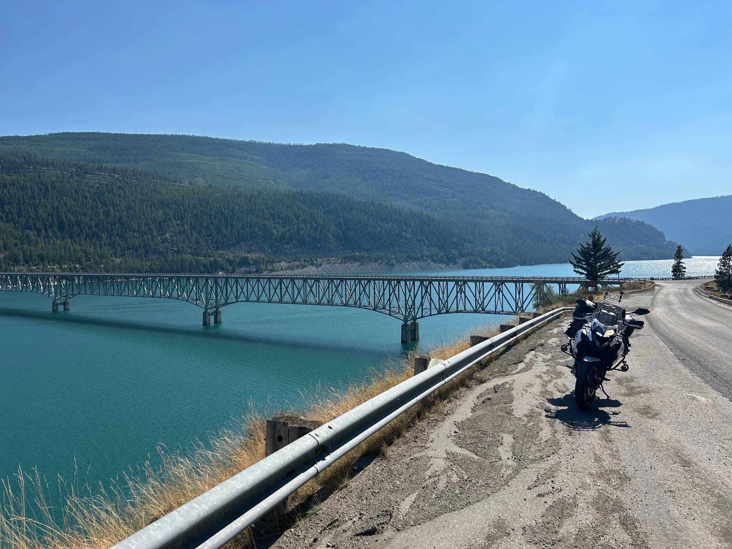 Trip Report: NW National Parks Loop
I left my job recently to take a much needed sabbatical and figure out what I’m doing next. A few weeks after my last day at work I embarked on what was to be a three week tour of NW-ish National Parks from Portland, to include Olympic, North Cascades, Glacier, Yellowstone, Grand Teton, Craters of the Moon, Lassen Volcanic, and Crater Lake.
I ended up missing Grand Tetons due to weather and I had to cut the trip short before I got to Lassen (family medical issue), so Lassen and Crater Lake remain unvisited.
Trip Dates: Sept 3 - Sept 16 (13 days)
Total Travel Miles: 3478 (does not include local miles for store runs, etc.)
Total Gallons of Gas Used: 82
Equipment: 2021 Benelli TRK502X Gaia GPS & Google Maps running on Sonim XP8 rugged Android phoneButler Motorcycle Maps (paper maps of best M/C roads in the country) iPhone 14 (main camera) Akaso Brave 7 helmet-mounted adventure camera Spot X satellite communicator and tracker Wolfman Luggage WP waterproof tank bag and saddle bags (no longer available) Watershed Colorado dry bag duffel (across the pillion seat) Kriega US-5 Drypack (tail bag) Kriega 3L hydration backpack (strapped to duffel, not worn)Marmot Ajax 2 tent Nemo hydrophobic down sleeping bag (non-mummy)Helinox ultralight cot MSR WhisperLite International stove
(Purchased in 1991 for my first moto trip: Detroit, MI to San Diego and back on an XT250)Gossamer Gear Bare Boxer bear-proof food canisters (two - one in each saddle bag)
Day 1 - Olympic National Park Date: Tuesday 9/3/2024
Destination: South Beach Campground, Olympic National Park
Travel Time: 4h 24m
Miles: 213Notes:
Planned to head west to Astoria then north from there, but left later than expected so headed up I-5 to US 12. I’ve driven/ridden that stretch of I-5 hundreds of times (starting in 1993). It’s boring and I hate it.
South Beach CG is first-come-first-served. I didn’t have issue getting a site. There is a long, tight loop of sites along the coastline, but I chose one of the sites further back near the bathrooms due to wind concerns. The bathroom building provided a sort of wind shelter for my site.
I used the heated grips on this leg; it was pretty chilly along the coast in the Olympic Peninsula. I almost didn’t install them, thinking I was being paranoid about the cold. I ended up using them a lot.
Day 2 - Ferry to Seattle / Burien Date: Wednesday 9/4/2024
Destination: Friend’s house in Burien, WA
Travel Time: 7h 30m
Miles: 199
Notes:
Slept well (thanks to Advil PM). I’ve not been sleeping well for more than a year. I’m really hoping to reset my sleep patterns with this trip. A good night’s sleep is one of my great joys and I feel like I’ve been robbed of that pleasure.
Used my Aeropress this morning for the first time ever. I’m hooked.
Headed up along US 101 through Port Angeles and then down to the Southworth ferry terminal near Port Orchard. Ferried across to Fauntleroy, which is just a few miles north my friend’s house in Burien. I’m always surprised at how long it takes to get from the Olympic Peninsula to the east side of Puget Sound (Seattle, etc.). With the ferry crossing (I love ferries) it took seven and a half hours to go 200 miles.
Discovered at my first stop of the day (just up 101 at the Kalaloch Campground, stopped to refill water) that the battery is quite weak and won’t start the bike if you leave the ignition on for even two minutes without the motor running. This would become a theme for the next few days. Fortunately, I have a jumper box and a permanent jump harness wired to the battery so jump starts are a quick operation.
Had a good evening with old friends.
Day 3 - North Cascades via Mountain Loop RoadDate: Thursday 9/5/2024
Destination: Newhalem Campground, North Cascades National Park
Travel Time: 4h 30m
Miles: 146Notes:
Slept well, on the couch. No pills needed.
I realized yesterday that my summer riding gloves (Rev’It Dune) were a size (or two) too small. Rev’It gloves fit really tight and I feel like I can never get it quite right. And yet, I love them. So, I stopped at a Cycle Gear in Bellevue to pick up something summer weight (Dirt 3) that fit better. They’re better, but maybe still one size too small. Such is life.
From Bellevue, I rode north and took the Mountain Loop Hwy then on up north to North Cascades. It was a hot ride. Still summer.
A small section of the Mountain Loop Road is dirt/gravel, which I didn’t realize. No biggie. Was just surprised (clearly I didn’t study my maps closely enough). When riding solo on a bike that weighs over 500 lbs., I tend to avoid planning much off-pavement riding. That’s what my DR-Z is for.
Day 4 - Newport, Washington via Winthrop Date: Friday 9/6/2024
Destination: Golden Spur Motor Inn, Newport, Washington
Travel Time: 8h
Miles: 308
Notes:
Slept just ok, even with Advil PM.
Pretty ride through North Cascades National Park and Colville National Forest. Didn’t do any backroads or hikes. Discovered (new to me) the town of Winthrop. Stopped for coffee at Sheri’s and resupplied on freeze-dried food at Cascades Outdoor Store.
The town of Newport is almost nothing, but, inexplicably, there’s an amazing restaurant (Brownell’s Place). Had dinner and a few ciders. Met and chatted with the owner/chef (she’s great). Listened to some live music. Then back to the motel.
Day 5 - New Battery in Kalispell Date: Saturday 9/7/2024
Destination: West Glacier KOA, West Glacier, MT
Travel Time: 8h 7m
Miles: 293
Notes:
Slept well on motel bed (on sleeping bag, not in the sheets). Another hot one.
Discovered that the water pump seal leaks oil. A quick post in the TRK Facebook group revealed that this is a common problem on this bike, and and easy fix. It’s apparently just a bad o-ring.
Battery has been getting continuously worse, and now requires I jump start the bike about every other start. Google Maps to the rescue: directions to the Batteries Plus in Kalispell, please. They don’t have an Odyssey AGM in the right size; the Duracell will have to do. (It’s been great.)
I set up camp at the West Glacier KOA, which will be my base for a few days. KOAs are their own little world. Very strange. Not really my thing, but the on-site laundry was handy.
After setting up camp I opened a cider and used the iPad to book a vehicle reservation for the next day to ride Going to the Sun Road, which I really wanted to do.
Day 6 - Going to the Sun RoadDate: Sunday 9/8/2024
Destination: Local Ride: West Glacier, Going to the Sun Road, Saint Mary, East Glacier
Travel Time: 5h 35m
Miles: 142Notes:
Quick breakfast and gas up in West Glacier before entering Going to the Sun Road.
Going to the Sun Road was stunning. This was the first point in the trip where I had tingles and was giddy at what I was seeing.
Took a very short hike along Saint Mary Lake. Again, I was beside myself with the beauty.
Lunch at the general store in Kiowa.
The rest of the ride back after East Glacier was meh, but I just kept thinking about how amazing what I’d seen in the morning had been.
Dinner at the KOA. Tacos from a cart (ok / not great, and a very weird guacamole) and a few glasses of wine from another cart. I asked about the guac and it turns out they make it in a food processor. Come on, people.
Day 7 - Ride to BozemanDate: Monday 9/9/2024
Destination: Friend’s house in Bozeman, Montana
Travel Time: ~ 8h (Gaia crashed near the end of the trip, but before getting to Bozeman)
Miles: ~ 400Notes:
Slept poorly again. No pills this time. Took some photos of my soft luggage setup to answer some questions in the TRK502X Facebook group. The saddle bags are from Wolfman Luggage, but I don’t think they make this waterproof line anymore. I use a duffel dry bag from Watershed across the top. A heat shield protects the side bag from exhaust heat.
Hazy, smoky ride most of the way. Very windy in places. This is where I first really started to feel how underpowered the TRK502 is. Really struggled in places.
Developed an engine-speed-sensitive squeak or rattle. Sounds like when a heat shield vibrates in resonance with engine vibration. Discovered that it’s a missing crash bar mounting bolt allowing the crash bar to rub against the frame.
Also noticed that there’s a resonant oscillation at speed that feels like the chain going bad (like it’s stretching unevenly).
First of several nights at a friend’s house in Bozeman (which, it turns out, is a pretty cool town). And there’s a hot tub…
Day 8 - Bike Maintenance & Hyalite ReservoirDate: Tuesday 9/10/2024
Destination: Local Ride: Hyalite Reservoir
Travel Time: not recorded
Miles: not recordedNotes:
Woke up to a smoky sunrise. I had the best night’s sleep I’ve had in years. This is was the whole point of this trip: to untangle my burnout and reclaim sleep as one of my joys. I wrote about it in my journal when I woke up. I hope this wasn’t a fluke.
Planned to replace the bolt that rattled loose from the crash bar, but instead discovered that it had actually severed off at the mount point. No fixing that on the road. Adjusted chain and moved on.
Lunch at Mountains Walking Brewery in Bozeman.
Rode up to Hyalite Reservoir. Pretty ride. Smoky still.
Soaked in hot tub after dinner.
Day 9 - North Yellowstone LoopDate: Wednesday 9/11/2024
Destination: Northern loop through Yellowstone National Park
Travel Time: 9h 36m
Miles: 272Notes:
Did a day trip from Bozeman down through the northern loop in Yellowstone, entering at Mammoth and taking the scenic route through Paradise Valley.
Saw elk, coyotes (I think), buffalo, and pronghorn.
Pretty ride, but cold in places. Used heated grips again.
Rode the loop through Mammoth Hot Springs (see video) at the end.
Coffee at Tumbleweed Bookstore & Cafe in Gardiner. I kind of dig Gardiner. Good vibe.
Had dinner at Mountains Walking Brewing. Rain and wind started. Lights flickered. Waited for rain to stop before riding back to the house.
Power out at the house due to high winds. This does not bode well for tomorrow.
Day 10 - Winter Weather in the ParksDate: Thursday 9/12/2024
Destination: Grand Teton National Park via West Yellowstone Pocatello, Idaho
Travel Time: 5h 40m
Miles: 201Notes:
Today was supposed to be a gorgeous ride through Yellowstone into Grand Teton National Park, and camping at Signal Mountain CG in the park. The weather had other ideas. It was pouring rain (and cold) all the way to West Yellowstone from Bozeman. By the time I got to West Yellowstone I was getting severe winter weather warnings on my phone calling for up to 3 (three!!) inches of snow accumulating in the high passes in the park. It’s bad enough in a car, but that’s a disaster waiting to happen on a motorcycle.
I parked my butt at Mountain Mama’s Cafe in West Yellowstone to warm up / dry off and decide what to do. I almost had myself convinced to push through when I realized that, even if I made it to the campground ok, I’d be setting up camp in the rain and I’d likely be miserable all night. Grand Teton would have to wait.
From West Yellowstone it’s easy to bail west into Idaho and get away from the park weather and elevations. So that’s what I did. It was not a pleasant ride, though. I was in torrential downpours all the way to Idaho Falls.
Arriving in Idaho Falls, I was exhausted and sure I could just find a room for the night. I dropped the bike at a roundabout (short-legged it coming to a stop; I knew it was going so I just rolled away). Guy behind me helped me pick it up. Then, there were no rooms because it was move in week for the two universities there (U of I, ISU). This would become a recurring theme.
I rode further to Blackfoot. Still no rooms.
I called ahead to Pocatello and got a room at a Red Lion there. I was never so happy to be off the bike.
No pictures this day. I couldn’t even get the action camera to turn on.
Day 11 - Craters of the Moon and EBR-1Date: Friday 9/13/2024
Destination: Craters of the Moon National Monument
Travel Time: 4h 20m
Miles: 124
Notes:
I wasn’t sure what my destination would be today but my plan was to do a little nuclear tourism, see Craters of the Moon, and then go somewhere from there. My schedule and day-plan was thrown off by missing Grand Teton National Park and spending a night in Pocatello, which was not on the itinerary at all.
Stopped in Atomic City. Not sure why; I was under the impression that Atomic City was the first city lit by nuclear engergy, but it was practically a ghost town. There are a few houses there, but as far as I could tell all of the business were shuttered. Except, maybe, for the race track; that looked like it might still get used.
Arco, it turns out, is the city celebrated as the first in the world to be lit by nuclear energy. Nothing special about the town, but they do a nice job of making City Hall photo-worthy.
Between Atomic City and Arco is EBR-1 (Experimental Breeder Reactor I) which was the world’s first breeder reactor. The EBR-1 exhibit was closed for the season, but in the lot next to it were some really interesting experimental nuclear heat-transfer jet engines that never made it out of the experimental phase (probably a good thing).
Craters of the Moon is pretty small. If you don’t do any of the walks, it’s literally just a 30 minute road loop. Still, it was an unexpected surprise and delight. I had no idea what to expect but I was positively chuffed at the experience. I noticed that the campground had open sites so I inquired at the entry booth. As luck would have it, the whole campground is first come / first serve. I decided to set up for the night. It’s good to be done early and have some time to read and not stress about making distance.
Day 12 - New Chain in Twin FallsDate: Saturday 9/14/2024
Destination: Battle Mountain, Nevada
Travel Time: 8h 52m
Miles: 335
Notes:
Beautiful morning in Craters of the Moon. While I was breaking camp a parade of classic cars came into the park to drive the loop. I got a picture of one Pontiac down the road in Carey at a gas station.
Carey ended up being an unplanned fork in the road for me. I discovered this morning that my chain was indeed stretching unevenly, and the oscillation I was feeling and hearing was the chain hum changing from a “loose” hum to a “tight” hum rapidly as the tight spot moved around the sprockets. I was supposed to continue west to Mountain Home and then south from there into Nevada. A very scenic route, according to my Butler map. But, between camp and the gas station I got pretty paranoid about the chain snapping at high speed, which, worst case, could lead to a fatal crash.
So I called ahead to a few motorcycle dealers in Mountain Home (on my planned route) to see if they could take me in and replace the chain. No dice. This is the downside of having an obscure motorcycle from an obscure marque - no one wants to work on it. Making matters worse this is an Italian-designed bike built in China, a fact which causes many people to lose the ability to think clearly. “It’s Chinese junk!” Not so. Next.
With Mountain Home out, I tried Twin Falls. My first call was to Adventure Motorsports, and the service manager there took me in with no hesitation. “How soon can you be here?” I didn’t get his name, but my hat’s off to him and his one tech working furiously on a Saturday to beat the 3pm closing time. He said during high season, they get about 15-20 out of town travelers per week who need something done, and they take them all in. I love to hear stuff like this. This shop is in it for the community. They have a nice showroom, too.
With a quality new chain installed, I got a burrito and a MexiCoke at a Mexican place and went on my way. I made it to Battle Mountain, NV, where I decide to get a room. Tomorrow I rejoin my planned scenic route. Day 13 - Desert Mountains in NV, CADate: Sunday 9/15/2024
Destination: Grizzly Campground, Lake Davis (near Portola, CA)
Travel Time: 7h
Miles: 307
Notes:
I love the northern Nevada landscape, and today’s ride didn’t disappoint. US Highway 50 is apparently known as “The Loneliest Highway” but everyone knows about it, so it’s not very lonely. However, after leaving Austin, NV headed west you can take Nevada Highway 722, which dips to the south and follows the old US 50 route. It was completely empty and the twisties through the passes were fun. Highly recommended.
Stopped in Fallon for gas and to find a Micro SD card for the action camera. Walmart to the rescue.
After Reno, I crossed into California and, I swear, it looks different. Norther California desert mountains are so beautiful.
Camped at a nearly empty campground on Lake Davis (very end of the season). The host warned me rain was coming tomorrow.
Day 14 - Unplanned Return HomeDate: Monday 9/16/2024
Destination: Summit Lake Campground, Lassen Volcanic National Park Portland, Oregon (Home)
Travel Time: 10h 32m
Miles: 538Notes:
Last week, my mom went into the hospital for a fairly routine procedure. My brother went to Michigan to help out, as needed, and he went back home to Arizona after she returned home and everything seemed settled.
This morning, while having coffee, I got a call that she’d gone back into the hospital with something that may or may not have been related to the procedure. It seemed like maybe things were ok, but maybe not.
I decided the best thing to do was head home so that I was near an airport if I needed to fly out to Michigan to help out.
I packed up camp and headed up US 395 toward home, via Klamath Falls. It was a pretty ride, but, once again, I found myself in rain most of the way to Klamath Falls.
I was pretty beat by the time I got to Klamath Falls and figured I’d just find a hotel room, get a hot shower, and finish the ride tomorrow.
But, once again, it was move-in week for the local university. Holiday Inn Express had a single room for $395. No thanks. Onward.
I never hit rain again after Klamath Falls, and after turning west onto Oregon Hwy 58 and starting to lose elevation into the Willamette Valley, the temperature starting rising, which was welcome.
Once I reached Eugene, there was no point in not just going all the way home, so that’s what I did.
I got two pictures: one at camp before the call, and one at my last gas stop, an hour and twenty minutes from home, with the moon rising.
A nice side effect of my early return home is that I was home for my birthday (tomorrow), so I had dinner with my kids and my wife, which was lovely.
I did end up flying to Michigan the next day, and was there for a bit. The best part? I got to make some meals for my mom and step dad. Everything seems ok with my mom for now.
Grand Teton, Lassen, and Crater Lake will be there, and now I have an excuse for another trip in the future.