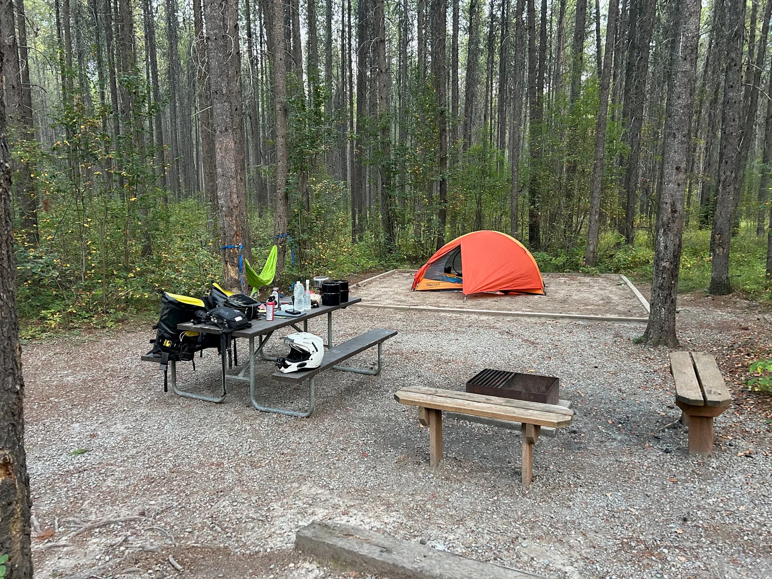 Trip Report: NW National Parks Loop
I left my job recently to take a much needed sabbatical and figure out what I’m doing next. A few weeks after my last day at work I embarked on what was to be a three week tour of NW-ish National Parks from Portland, to include Olympic, North Cascades, Glacier, Yellowstone, Grand Teton, Craters of the Moon, Lassen Volcanic, and Crater Lake.
I ended up missing Grand Tetons due to weather and I had to cut the trip short before I got to Lassen (family medical issue), so Lassen and Crater Lake remain unvisited.
Trip Dates: Sept 3 - Sept 16 (13 days)
Total Travel Miles: 3478 (does not include local miles for store runs, etc.)
Total Gallons of Gas Used: 82
Equipment: 2021 Benelli TRK502X Gaia GPS & Google Maps running on Sonim XP8 rugged Android phoneButler Motorcycle Maps (paper maps of best M/C roads in the country) iPhone 14 (main camera) Akaso Brave 7 helmet-mounted adventure camera Spot X satellite communicator and tracker Wolfman Luggage WP waterproof tank bag and saddle bags (no longer available) Watershed Colorado dry bag duffel (across the pillion seat) Kriega US-5 Drypack (tail bag) Kriega 3L hydration backpack (strapped to duffel, not worn)Marmot Ajax 2 tent Nemo hydrophobic down sleeping bag (non-mummy)Helinox ultralight cot MSR WhisperLite International stove
(Purchased in 1991 for my first moto trip: Detroit, MI to San Diego and back on an XT250)Gossamer Gear Bare Boxer bear-proof food canisters (two - one in each saddle bag)
Day 1 - Olympic National Park Date: Tuesday 9/3/2024
Destination: South Beach Campground, Olympic National Park
Travel Time: 4h 24m
Miles: 213Notes:
Planned to head west to Astoria then north from there, but left later than expected so headed up I-5 to US 12. I’ve driven/ridden that stretch of I-5 hundreds of times (starting in 1993). It’s boring and I hate it.
South Beach CG is first-come-first-served. I didn’t have issue getting a site. There is a long, tight loop of sites along the coastline, but I chose one of the sites further back near the bathrooms due to wind concerns. The bathroom building provided a sort of wind shelter for my site.
I used the heated grips on this leg; it was pretty chilly along the coast in the Olympic Peninsula. I almost didn’t install them, thinking I was being paranoid about the cold. I ended up using them a lot.
Day 2 - Ferry to Seattle / Burien Date: Wednesday 9/4/2024
Destination: Friend’s house in Burien, WA
Travel Time: 7h 30m
Miles: 199
Notes:
Slept well (thanks to Advil PM). I’ve not been sleeping well for more than a year. I’m really hoping to reset my sleep patterns with this trip. A good night’s sleep is one of my great joys and I feel like I’ve been robbed of that pleasure.
Used my Aeropress this morning for the first time ever. I’m hooked.
Headed up along US 101 through Port Angeles and then down to the Southworth ferry terminal near Port Orchard. Ferried across to Fauntleroy, which is just a few miles north my friend’s house in Burien. I’m always surprised at how long it takes to get from the Olympic Peninsula to the east side of Puget Sound (Seattle, etc.). With the ferry crossing (I love ferries) it took seven and a half hours to go 200 miles.
Discovered at my first stop of the day (just up 101 at the Kalaloch Campground, stopped to refill water) that the battery is quite weak and won’t start the bike if you leave the ignition on for even two minutes without the motor running. This would become a theme for the next few days. Fortunately, I have a jumper box and a permanent jump harness wired to the battery so jump starts are a quick operation.
Had a good evening with old friends.
Day 3 - North Cascades via Mountain Loop RoadDate: Thursday 9/5/2024
Destination: Newhalem Campground, North Cascades National Park
Travel Time: 4h 30m
Miles: 146Notes:
Slept well, on the couch. No pills needed.
I realized yesterday that my summer riding gloves (Rev’It Dune) were a size (or two) too small. Rev’It gloves fit really tight and I feel like I can never get it quite right. And yet, I love them. So, I stopped at a Cycle Gear in Bellevue to pick up something summer weight (Dirt 3) that fit better. They’re better, but maybe still one size too small. Such is life.
From Bellevue, I rode north and took the Mountain Loop Hwy then on up north to North Cascades. It was a hot ride. Still summer.
A small section of the Mountain Loop Road is dirt/gravel, which I didn’t realize. No biggie. Was just surprised (clearly I didn’t study my maps closely enough). When riding solo on a bike that weighs over 500 lbs., I tend to avoid planning much off-pavement riding. That’s what my DR-Z is for.
Day 4 - Newport, Washington via Winthrop Date: Friday 9/6/2024
Destination: Golden Spur Motor Inn, Newport, Washington
Travel Time: 8h
Miles: 308
Notes:
Slept just ok, even with Advil PM.
Pretty ride through North Cascades National Park and Colville National Forest. Didn’t do any backroads or hikes. Discovered (new to me) the town of Winthrop. Stopped for coffee at Sheri’s and resupplied on freeze-dried food at Cascades Outdoor Store.
The town of Newport is almost nothing, but, inexplicably, there’s an amazing restaurant (Brownell’s Place). Had dinner and a few ciders. Met and chatted with the owner/chef (she’s great). Listened to some live music. Then back to the motel.
Day 5 - New Battery in Kalispell Date: Saturday 9/7/2024
Destination: West Glacier KOA, West Glacier, MT
Travel Time: 8h 7m
Miles: 293
Notes:
Slept well on motel bed (on sleeping bag, not in the sheets). Another hot one.
Discovered that the water pump seal leaks oil. A quick post in the TRK Facebook group revealed that this is a common problem on this bike, and and easy fix. It’s apparently just a bad o-ring.
Battery has been getting continuously worse, and now requires I jump start the bike about every other start. Google Maps to the rescue: directions to the Batteries Plus in Kalispell, please. They don’t have an Odyssey AGM in the right size; the Duracell will have to do. (It’s been great.)
I set up camp at the West Glacier KOA, which will be my base for a few days. KOAs are their own little world. Very strange. Not really my thing, but the on-site laundry was handy.
After setting up camp I opened a cider and used the iPad to book a vehicle reservation for the next day to ride Going to the Sun Road, which I really wanted to do.
Day 6 - Going to the Sun RoadDate: Sunday 9/8/2024
Destination: Local Ride: West Glacier, Going to the Sun Road, Saint Mary, East Glacier
Travel Time: 5h 35m
Miles: 142Notes:
Quick breakfast and gas up in West Glacier before entering Going to the Sun Road.
Going to the Sun Road was stunning. This was the first point in the trip where I had tingles and was giddy at what I was seeing.
Took a very short hike along Saint Mary Lake. Again, I was beside myself with the beauty.
Lunch at the general store in Kiowa.
The rest of the ride back after East Glacier was meh, but I just kept thinking about how amazing what I’d seen in the morning had been.
Dinner at the KOA. Tacos from a cart (ok / not great, and a very weird guacamole) and a few glasses of wine from another cart. I asked about the guac and it turns out they make it in a food processor. Come on, people.
Day 7 - Ride to BozemanDate: Monday 9/9/2024
Destination: Friend’s house in Bozeman, Montana
Travel Time: ~ 8h (Gaia crashed near the end of the trip, but before getting to Bozeman)
Miles: ~ 400Notes:
Slept poorly again. No pills this time. Took some photos of my soft luggage setup to answer some questions in the TRK502X Facebook group. The saddle bags are from Wolfman Luggage, but I don’t think they make this waterproof line anymore. I use a duffel dry bag from Watershed across the top. A heat shield protects the side bag from exhaust heat.
Hazy, smoky ride most of the way. Very windy in places. This is where I first really started to feel how underpowered the TRK502 is. Really struggled in places.
Developed an engine-speed-sensitive squeak or rattle. Sounds like when a heat shield vibrates in resonance with engine vibration. Discovered that it’s a missing crash bar mounting bolt allowing the crash bar to rub against the frame.
Also noticed that there’s a resonant oscillation at speed that feels like the chain going bad (like it’s stretching unevenly).
First of several nights at a friend’s house in Bozeman (which, it turns out, is a pretty cool town). And there’s a hot tub…
Day 8 - Bike Maintenance & Hyalite ReservoirDate: Tuesday 9/10/2024
Destination: Local Ride: Hyalite Reservoir
Travel Time: not recorded
Miles: not recordedNotes:
Woke up to a smoky sunrise. I had the best night’s sleep I’ve had in years. This is was the whole point of this trip: to untangle my burnout and reclaim sleep as one of my joys. I wrote about it in my journal when I woke up. I hope this wasn’t a fluke.
Planned to replace the bolt that rattled loose from the crash bar, but instead discovered that it had actually severed off at the mount point. No fixing that on the road. Adjusted chain and moved on.
Lunch at Mountains Walking Brewery in Bozeman.
Rode up to Hyalite Reservoir. Pretty ride. Smoky still.
Soaked in hot tub after dinner.
Day 9 - North Yellowstone LoopDate: Wednesday 9/11/2024
Destination: Northern loop through Yellowstone National Park
Travel Time: 9h 36m
Miles: 272Notes:
Did a day trip from Bozeman down through the northern loop in Yellowstone, entering at Mammoth and taking the scenic route through Paradise Valley.
Saw elk, coyotes (I think), buffalo, and pronghorn.
Pretty ride, but cold in places. Used heated grips again.
Rode the loop through Mammoth Hot Springs (see video) at the end.
Coffee at Tumbleweed Bookstore & Cafe in Gardiner. I kind of dig Gardiner. Good vibe.
Had dinner at Mountains Walking Brewing. Rain and wind started. Lights flickered. Waited for rain to stop before riding back to the house.
Power out at the house due to high winds. This does not bode well for tomorrow.
Day 10 - Winter Weather in the ParksDate: Thursday 9/12/2024
Destination: Grand Teton National Park via West Yellowstone Pocatello, Idaho
Travel Time: 5h 40m
Miles: 201Notes:
Today was supposed to be a gorgeous ride through Yellowstone into Grand Teton National Park, and camping at Signal Mountain CG in the park. The weather had other ideas. It was pouring rain (and cold) all the way to West Yellowstone from Bozeman. By the time I got to West Yellowstone I was getting severe winter weather warnings on my phone calling for up to 3 (three!!) inches of snow accumulating in the high passes in the park. It’s bad enough in a car, but that’s a disaster waiting to happen on a motorcycle.
I parked my butt at Mountain Mama’s Cafe in West Yellowstone to warm up / dry off and decide what to do. I almost had myself convinced to push through when I realized that, even if I made it to the campground ok, I’d be setting up camp in the rain and I’d likely be miserable all night. Grand Teton would have to wait.
From West Yellowstone it’s easy to bail west into Idaho and get away from the park weather and elevations. So that’s what I did. It was not a pleasant ride, though. I was in torrential downpours all the way to Idaho Falls.
Arriving in Idaho Falls, I was exhausted and sure I could just find a room for the night. I dropped the bike at a roundabout (short-legged it coming to a stop; I knew it was going so I just rolled away). Guy behind me helped me pick it up. Then, there were no rooms because it was move in week for the two universities there (U of I, ISU). This would become a recurring theme.
I rode further to Blackfoot. Still no rooms.
I called ahead to Pocatello and got a room at a Red Lion there. I was never so happy to be off the bike.
No pictures this day. I couldn’t even get the action camera to turn on.
Day 11 - Craters of the Moon and EBR-1Date: Friday 9/13/2024
Destination: Craters of the Moon National Monument
Travel Time: 4h 20m
Miles: 124
Notes:
I wasn’t sure what my destination would be today but my plan was to do a little nuclear tourism, see Craters of the Moon, and then go somewhere from there. My schedule and day-plan was thrown off by missing Grand Teton National Park and spending a night in Pocatello, which was not on the itinerary at all.
Stopped in Atomic City. Not sure why; I was under the impression that Atomic City was the first city lit by nuclear engergy, but it was practically a ghost town. There are a few houses there, but as far as I could tell all of the business were shuttered. Except, maybe, for the race track; that looked like it might still get used.
Arco, it turns out, is the city celebrated as the first in the world to be lit by nuclear energy. Nothing special about the town, but they do a nice job of making City Hall photo-worthy.
Between Atomic City and Arco is EBR-1 (Experimental Breeder Reactor I) which was the world’s first breeder reactor. The EBR-1 exhibit was closed for the season, but in the lot next to it were some really interesting experimental nuclear heat-transfer jet engines that never made it out of the experimental phase (probably a good thing).
Craters of the Moon is pretty small. If you don’t do any of the walks, it’s literally just a 30 minute road loop. Still, it was an unexpected surprise and delight. I had no idea what to expect but I was positively chuffed at the experience. I noticed that the campground had open sites so I inquired at the entry booth. As luck would have it, the whole campground is first come / first serve. I decided to set up for the night. It’s good to be done early and have some time to read and not stress about making distance.
Day 12 - New Chain in Twin FallsDate: Saturday 9/14/2024
Destination: Battle Mountain, Nevada
Travel Time: 8h 52m
Miles: 335
Notes:
Beautiful morning in Craters of the Moon. While I was breaking camp a parade of classic cars came into the park to drive the loop. I got a picture of one Pontiac down the road in Carey at a gas station.
Carey ended up being an unplanned fork in the road for me. I discovered this morning that my chain was indeed stretching unevenly, and the oscillation I was feeling and hearing was the chain hum changing from a “loose” hum to a “tight” hum rapidly as the tight spot moved around the sprockets. I was supposed to continue west to Mountain Home and then south from there into Nevada. A very scenic route, according to my Butler map. But, between camp and the gas station I got pretty paranoid about the chain snapping at high speed, which, worst case, could lead to a fatal crash.
So I called ahead to a few motorcycle dealers in Mountain Home (on my planned route) to see if they could take me in and replace the chain. No dice. This is the downside of having an obscure motorcycle from an obscure marque - no one wants to work on it. Making matters worse this is an Italian-designed bike built in China, a fact which causes many people to lose the ability to think clearly. “It’s Chinese junk!” Not so. Next.
With Mountain Home out, I tried Twin Falls. My first call was to Adventure Motorsports, and the service manager there took me in with no hesitation. “How soon can you be here?” I didn’t get his name, but my hat’s off to him and his one tech working furiously on a Saturday to beat the 3pm closing time. He said during high season, they get about 15-20 out of town travelers per week who need something done, and they take them all in. I love to hear stuff like this. This shop is in it for the community. They have a nice showroom, too.
With a quality new chain installed, I got a burrito and a MexiCoke at a Mexican place and went on my way. I made it to Battle Mountain, NV, where I decide to get a room. Tomorrow I rejoin my planned scenic route. Day 13 - Desert Mountains in NV, CADate: Sunday 9/15/2024
Destination: Grizzly Campground, Lake Davis (near Portola, CA)
Travel Time: 7h
Miles: 307
Notes:
I love the northern Nevada landscape, and today’s ride didn’t disappoint. US Highway 50 is apparently known as “The Loneliest Highway” but everyone knows about it, so it’s not very lonely. However, after leaving Austin, NV headed west you can take Nevada Highway 722, which dips to the south and follows the old US 50 route. It was completely empty and the twisties through the passes were fun. Highly recommended.
Stopped in Fallon for gas and to find a Micro SD card for the action camera. Walmart to the rescue.
After Reno, I crossed into California and, I swear, it looks different. Norther California desert mountains are so beautiful.
Camped at a nearly empty campground on Lake Davis (very end of the season). The host warned me rain was coming tomorrow.
Day 14 - Unplanned Return HomeDate: Monday 9/16/2024
Destination: Summit Lake Campground, Lassen Volcanic National Park Portland, Oregon (Home)
Travel Time: 10h 32m
Miles: 538Notes:
Last week, my mom went into the hospital for a fairly routine procedure. My brother went to Michigan to help out, as needed, and he went back home to Arizona after she returned home and everything seemed settled.
This morning, while having coffee, I got a call that she’d gone back into the hospital with something that may or may not have been related to the procedure. It seemed like maybe things were ok, but maybe not.
I decided the best thing to do was head home so that I was near an airport if I needed to fly out to Michigan to help out.
I packed up camp and headed up US 395 toward home, via Klamath Falls. It was a pretty ride, but, once again, I found myself in rain most of the way to Klamath Falls.
I was pretty beat by the time I got to Klamath Falls and figured I’d just find a hotel room, get a hot shower, and finish the ride tomorrow.
But, once again, it was move-in week for the local university. Holiday Inn Express had a single room for $395. No thanks. Onward.
I never hit rain again after Klamath Falls, and after turning west onto Oregon Hwy 58 and starting to lose elevation into the Willamette Valley, the temperature starting rising, which was welcome.
Once I reached Eugene, there was no point in not just going all the way home, so that’s what I did.
I got two pictures: one at camp before the call, and one at my last gas stop, an hour and twenty minutes from home, with the moon rising.
A nice side effect of my early return home is that I was home for my birthday (tomorrow), so I had dinner with my kids and my wife, which was lovely.
I did end up flying to Michigan the next day, and was there for a bit. The best part? I got to make some meals for my mom and step dad. Everything seems ok with my mom for now.
Grand Teton, Lassen, and Crater Lake will be there, and now I have an excuse for another trip in the future.