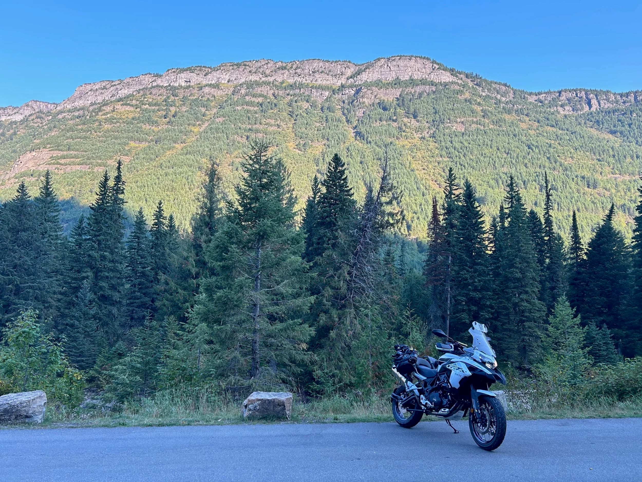 Trip Report: NW National Parks Loop
I left my job recently to take a much needed sabbatical and figure out what I’m doing next. A few weeks after my last day at work I embarked on what was to be a three week tour of NW-ish National Parks from Portland, to include Olympic, North Cascades, Glacier, Yellowstone, Grand Teton, Craters of the Moon, Lassen Volcanic, and Crater Lake.
I ended up missing Grand Tetons due to weather and I had to cut the trip short before I got to Lassen (family medical issue), so Lassen and Crater Lake remain unvisited.
Trip Dates: Sept 3 - Sept 16 (13 days)
Total Travel Miles: 3478 (does not include local miles for store runs, etc.)
Total Gallons of Gas Used: 82
Equipment: 2021 Benelli TRK502X Gaia GPS & Google Maps running on Sonim XP8 rugged Android phoneButler Motorcycle Maps (paper maps of best M/C roads in the country) iPhone 14 (main camera) Akaso Brave 7 helmet-mounted adventure camera Spot X satellite communicator and tracker Wolfman Luggage WP waterproof tank bag and saddle bags (no longer available) Watershed Colorado dry bag duffel (across the pillion seat) Kriega US-5 Drypack (tail bag) Kriega 3L hydration backpack (strapped to duffel, not worn)Marmot Ajax 2 tent Nemo hydrophobic down sleeping bag (non-mummy)Helinox ultralight cot MSR WhisperLite International stove
(Purchased in 1991 for my first moto trip: Detroit, MI to San Diego and back on an XT250)Gossamer Gear Bare Boxer bear-proof food canisters (two - one in each saddle bag)
Day 1 - Olympic National Park Date: Tuesday 9/3/2024
Destination: South Beach Campground, Olympic National Park
Travel Time: 4h 24m
Miles: 213Notes:
Planned to head west to Astoria then north from there, but left later than expected so headed up I-5 to US 12. I’ve driven/ridden that stretch of I-5 hundreds of times (starting in 1993). It’s boring and I hate it.
South Beach CG is first-come-first-served. I didn’t have issue getting a site. There is a long, tight loop of sites along the coastline, but I chose one of the sites further back near the bathrooms due to wind concerns. The bathroom building provided a sort of wind shelter for my site.
I used the heated grips on this leg; it was pretty chilly along the coast in the Olympic Peninsula. I almost didn’t install them, thinking I was being paranoid about the cold. I ended up using them a lot.
Day 2 - Ferry to Seattle / Burien Date: Wednesday 9/4/2024
Destination: Friend’s house in Burien, WA
Travel Time: 7h 30m
Miles: 199
Notes:
Slept well (thanks to Advil PM). I’ve not been sleeping well for more than a year. I’m really hoping to reset my sleep patterns with this trip. A good night’s sleep is one of my great joys and I feel like I’ve been robbed of that pleasure.
Used my Aeropress this morning for the first time ever. I’m hooked.
Headed up along US 101 through Port Angeles and then down to the Southworth ferry terminal near Port Orchard. Ferried across to Fauntleroy, which is just a few miles north my friend’s house in Burien. I’m always surprised at how long it takes to get from the Olympic Peninsula to the east side of Puget Sound (Seattle, etc.). With the ferry crossing (I love ferries) it took seven and a half hours to go 200 miles.
Discovered at my first stop of the day (just up 101 at the Kalaloch Campground, stopped to refill water) that the battery is quite weak and won’t start the bike if you leave the ignition on for even two minutes without the motor running. This would become a theme for the next few days. Fortunately, I have a jumper box and a permanent jump harness wired to the battery so jump starts are a quick operation.
Had a good evening with old friends.
Day 3 - North Cascades via Mountain Loop RoadDate: Thursday 9/5/2024
Destination: Newhalem Campground, North Cascades National Park
Travel Time: 4h 30m
Miles: 146Notes:
Slept well, on the couch. No pills needed.
I realized yesterday that my summer riding gloves (Rev’It Dune) were a size (or two) too small. Rev’It gloves fit really tight and I feel like I can never get it quite right. And yet, I love them. So, I stopped at a Cycle Gear in Bellevue to pick up something summer weight (Dirt 3) that fit better. They’re better, but maybe still one size too small. Such is life.
From Bellevue, I rode north and took the Mountain Loop Hwy then on up north to North Cascades. It was a hot ride. Still summer.
A small section of the Mountain Loop Road is dirt/gravel, which I didn’t realize. No biggie. Was just surprised (clearly I didn’t study my maps closely enough). When riding solo on a bike that weighs over 500 lbs., I tend to avoid planning much off-pavement riding. That’s what my DR-Z is for.
Day 4 - Newport, Washington via Winthrop Date: Friday 9/6/2024
Destination: Golden Spur Motor Inn, Newport, Washington
Travel Time: 8h
Miles: 308
Notes:
Slept just ok, even with Advil PM.
Pretty ride through North Cascades National Park and Colville National Forest. Didn’t do any backroads or hikes. Discovered (new to me) the town of Winthrop. Stopped for coffee at Sheri’s and resupplied on freeze-dried food at Cascades Outdoor Store.
The town of Newport is almost nothing, but, inexplicably, there’s an amazing restaurant (Brownell’s Place). Had dinner and a few ciders. Met and chatted with the owner/chef (she’s great). Listened to some live music. Then back to the motel.
Day 5 - New Battery in Kalispell Date: Saturday 9/7/2024
Destination: West Glacier KOA, West Glacier, MT
Travel Time: 8h 7m
Miles: 293
Notes:
Slept well on motel bed (on sleeping bag, not in the sheets). Another hot one.
Discovered that the water pump seal leaks oil. A quick post in the TRK Facebook group revealed that this is a common problem on this bike, and and easy fix. It’s apparently just a bad o-ring.
Battery has been getting continuously worse, and now requires I jump start the bike about every other start. Google Maps to the rescue: directions to the Batteries Plus in Kalispell, please. They don’t have an Odyssey AGM in the right size; the Duracell will have to do. (It’s been great.)
I set up camp at the West Glacier KOA, which will be my base for a few days. KOAs are their own little world. Very strange. Not really my thing, but the on-site laundry was handy.
After setting up camp I opened a cider and used the iPad to book a vehicle reservation for the next day to ride Going to the Sun Road, which I really wanted to do.
Day 6 - Going to the Sun RoadDate: Sunday 9/8/2024
Destination: Local Ride: West Glacier, Going to the Sun Road, Saint Mary, East Glacier
Travel Time: 5h 35m
Miles: 142Notes:
Quick breakfast and gas up in West Glacier before entering Going to the Sun Road.
Going to the Sun Road was stunning. This was the first point in the trip where I had tingles and was giddy at what I was seeing.
Took a very short hike along Saint Mary Lake. Again, I was beside myself with the beauty.
Lunch at the general store in Kiowa.
The rest of the ride back after East Glacier was meh, but I just kept thinking about how amazing what I’d seen in the morning had been.
Dinner at the KOA. Tacos from a cart (ok / not great, and a very weird guacamole) and a few glasses of wine from another cart. I asked about the guac and it turns out they make it in a food processor. Come on, people.
Day 7 - Ride to BozemanDate: Monday 9/9/2024
Destination: Friend’s house in Bozeman, Montana
Travel Time: ~ 8h (Gaia crashed near the end of the trip, but before getting to Bozeman)
Miles: ~ 400Notes:
Slept poorly again. No pills this time. Took some photos of my soft luggage setup to answer some questions in the TRK502X Facebook group. The saddle bags are from Wolfman Luggage, but I don’t think they make this waterproof line anymore. I use a duffel dry bag from Watershed across the top. A heat shield protects the side bag from exhaust heat.
Hazy, smoky ride most of the way. Very windy in places. This is where I first really started to feel how underpowered the TRK502 is. Really struggled in places.
Developed an engine-speed-sensitive squeak or rattle. Sounds like when a heat shield vibrates in resonance with engine vibration. Discovered that it’s a missing crash bar mounting bolt allowing the crash bar to rub against the frame.
Also noticed that there’s a resonant oscillation at speed that feels like the chain going bad (like it’s stretching unevenly).
First of several nights at a friend’s house in Bozeman (which, it turns out, is a pretty cool town). And there’s a hot tub…
Day 8 - Bike Maintenance & Hyalite ReservoirDate: Tuesday 9/10/2024
Destination: Local Ride: Hyalite Reservoir
Travel Time: not recorded
Miles: not recordedNotes:
Woke up to a smoky sunrise. I had the best night’s sleep I’ve had in years. This is was the whole point of this trip: to untangle my burnout and reclaim sleep as one of my joys. I wrote about it in my journal when I woke up. I hope this wasn’t a fluke.
Planned to replace the bolt that rattled loose from the crash bar, but instead discovered that it had actually severed off at the mount point. No fixing that on the road. Adjusted chain and moved on.
Lunch at Mountains Walking Brewery in Bozeman.
Rode up to Hyalite Reservoir. Pretty ride. Smoky still.
Soaked in hot tub after dinner.
Day 9 - North Yellowstone LoopDate: Wednesday 9/11/2024
Destination: Northern loop through Yellowstone National Park
Travel Time: 9h 36m
Miles: 272Notes:
Did a day trip from Bozeman down through the northern loop in Yellowstone, entering at Mammoth and taking the scenic route through Paradise Valley.
Saw elk, coyotes (I think), buffalo, and pronghorn.
Pretty ride, but cold in places. Used heated grips again.
Rode the loop through Mammoth Hot Springs (see video) at the end.
Coffee at Tumbleweed Bookstore & Cafe in Gardiner. I kind of dig Gardiner. Good vibe.
Had dinner at Mountains Walking Brewing. Rain and wind started. Lights flickered. Waited for rain to stop before riding back to the house.
Power out at the house due to high winds. This does not bode well for tomorrow.
Day 10 - Winter Weather in the ParksDate: Thursday 9/12/2024
Destination: Grand Teton National Park via West Yellowstone Pocatello, Idaho
Travel Time: 5h 40m
Miles: 201Notes:
Today was supposed to be a gorgeous ride through Yellowstone into Grand Teton National Park, and camping at Signal Mountain CG in the park. The weather had other ideas. It was pouring rain (and cold) all the way to West Yellowstone from Bozeman. By the time I got to West Yellowstone I was getting severe winter weather warnings on my phone calling for up to 3 (three!!) inches of snow accumulating in the high passes in the park. It’s bad enough in a car, but that’s a disaster waiting to happen on a motorcycle.
I parked my butt at Mountain Mama’s Cafe in West Yellowstone to warm up / dry off and decide what to do. I almost had myself convinced to push through when I realized that, even if I made it to the campground ok, I’d be setting up camp in the rain and I’d likely be miserable all night. Grand Teton would have to wait.
From West Yellowstone it’s easy to bail west into Idaho and get away from the park weather and elevations. So that’s what I did. It was not a pleasant ride, though. I was in torrential downpours all the way to Idaho Falls.
Arriving in Idaho Falls, I was exhausted and sure I could just find a room for the night. I dropped the bike at a roundabout (short-legged it coming to a stop; I knew it was going so I just rolled away). Guy behind me helped me pick it up. Then, there were no rooms because it was move in week for the two universities there (U of I, ISU). This would become a recurring theme.
I rode further to Blackfoot. Still no rooms.
I called ahead to Pocatello and got a room at a Red Lion there. I was never so happy to be off the bike.
No pictures this day. I couldn’t even get the action camera to turn on.
Day 11 - Craters of the Moon and EBR-1Date: Friday 9/13/2024
Destination: Craters of the Moon National Monument
Travel Time: 4h 20m
Miles: 124
Notes:
I wasn’t sure what my destination would be today but my plan was to do a little nuclear tourism, see Craters of the Moon, and then go somewhere from there. My schedule and day-plan was thrown off by missing Grand Teton National Park and spending a night in Pocatello, which was not on the itinerary at all.
Stopped in Atomic City. Not sure why; I was under the impression that Atomic City was the first city lit by nuclear engergy, but it was practically a ghost town. There are a few houses there, but as far as I could tell all of the business were shuttered. Except, maybe, for the race track; that looked like it might still get used.
Arco, it turns out, is the city celebrated as the first in the world to be lit by nuclear energy. Nothing special about the town, but they do a nice job of making City Hall photo-worthy.
Between Atomic City and Arco is EBR-1 (Experimental Breeder Reactor I) which was the world’s first breeder reactor. The EBR-1 exhibit was closed for the season, but in the lot next to it were some really interesting experimental nuclear heat-transfer jet engines that never made it out of the experimental phase (probably a good thing).
Craters of the Moon is pretty small. If you don’t do any of the walks, it’s literally just a 30 minute road loop. Still, it was an unexpected surprise and delight. I had no idea what to expect but I was positively chuffed at the experience. I noticed that the campground had open sites so I inquired at the entry booth. As luck would have it, the whole campground is first come / first serve. I decided to set up for the night. It’s good to be done early and have some time to read and not stress about making distance.
Day 12 - New Chain in Twin FallsDate: Saturday 9/14/2024
Destination: Battle Mountain, Nevada
Travel Time: 8h 52m
Miles: 335
Notes:
Beautiful morning in Craters of the Moon. While I was breaking camp a parade of classic cars came into the park to drive the loop. I got a picture of one Pontiac down the road in Carey at a gas station.
Carey ended up being an unplanned fork in the road for me. I discovered this morning that my chain was indeed stretching unevenly, and the oscillation I was feeling and hearing was the chain hum changing from a “loose” hum to a “tight” hum rapidly as the tight spot moved around the sprockets. I was supposed to continue west to Mountain Home and then south from there into Nevada. A very scenic route, according to my Butler map. But, between camp and the gas station I got pretty paranoid about the chain snapping at high speed, which, worst case, could lead to a fatal crash.
So I called ahead to a few motorcycle dealers in Mountain Home (on my planned route) to see if they could take me in and replace the chain. No dice. This is the downside of having an obscure motorcycle from an obscure marque - no one wants to work on it. Making matters worse this is an Italian-designed bike built in China, a fact which causes many people to lose the ability to think clearly. “It’s Chinese junk!” Not so. Next.
With Mountain Home out, I tried Twin Falls. My first call was to Adventure Motorsports, and the service manager there took me in with no hesitation. “How soon can you be here?” I didn’t get his name, but my hat’s off to him and his one tech working furiously on a Saturday to beat the 3pm closing time. He said during high season, they get about 15-20 out of town travelers per week who need something done, and they take them all in. I love to hear stuff like this. This shop is in it for the community. They have a nice showroom, too.
With a quality new chain installed, I got a burrito and a MexiCoke at a Mexican place and went on my way. I made it to Battle Mountain, NV, where I decide to get a room. Tomorrow I rejoin my planned scenic route. Day 13 - Desert Mountains in NV, CADate: Sunday 9/15/2024
Destination: Grizzly Campground, Lake Davis (near Portola, CA)
Travel Time: 7h
Miles: 307
Notes:
I love the northern Nevada landscape, and today’s ride didn’t disappoint. US Highway 50 is apparently known as “The Loneliest Highway” but everyone knows about it, so it’s not very lonely. However, after leaving Austin, NV headed west you can take Nevada Highway 722, which dips to the south and follows the old US 50 route. It was completely empty and the twisties through the passes were fun. Highly recommended.
Stopped in Fallon for gas and to find a Micro SD card for the action camera. Walmart to the rescue.
After Reno, I crossed into California and, I swear, it looks different. Norther California desert mountains are so beautiful.
Camped at a nearly empty campground on Lake Davis (very end of the season). The host warned me rain was coming tomorrow.
Day 14 - Unplanned Return HomeDate: Monday 9/16/2024
Destination: Summit Lake Campground, Lassen Volcanic National Park Portland, Oregon (Home)
Travel Time: 10h 32m
Miles: 538Notes:
Last week, my mom went into the hospital for a fairly routine procedure. My brother went to Michigan to help out, as needed, and he went back home to Arizona after she returned home and everything seemed settled.
This morning, while having coffee, I got a call that she’d gone back into the hospital with something that may or may not have been related to the procedure. It seemed like maybe things were ok, but maybe not.
I decided the best thing to do was head home so that I was near an airport if I needed to fly out to Michigan to help out.
I packed up camp and headed up US 395 toward home, via Klamath Falls. It was a pretty ride, but, once again, I found myself in rain most of the way to Klamath Falls.
I was pretty beat by the time I got to Klamath Falls and figured I’d just find a hotel room, get a hot shower, and finish the ride tomorrow.
But, once again, it was move-in week for the local university. Holiday Inn Express had a single room for $395. No thanks. Onward.
I never hit rain again after Klamath Falls, and after turning west onto Oregon Hwy 58 and starting to lose elevation into the Willamette Valley, the temperature starting rising, which was welcome.
Once I reached Eugene, there was no point in not just going all the way home, so that’s what I did.
I got two pictures: one at camp before the call, and one at my last gas stop, an hour and twenty minutes from home, with the moon rising.
A nice side effect of my early return home is that I was home for my birthday (tomorrow), so I had dinner with my kids and my wife, which was lovely.
I did end up flying to Michigan the next day, and was there for a bit. The best part? I got to make some meals for my mom and step dad. Everything seems ok with my mom for now.
Grand Teton, Lassen, and Crater Lake will be there, and now I have an excuse for another trip in the future.