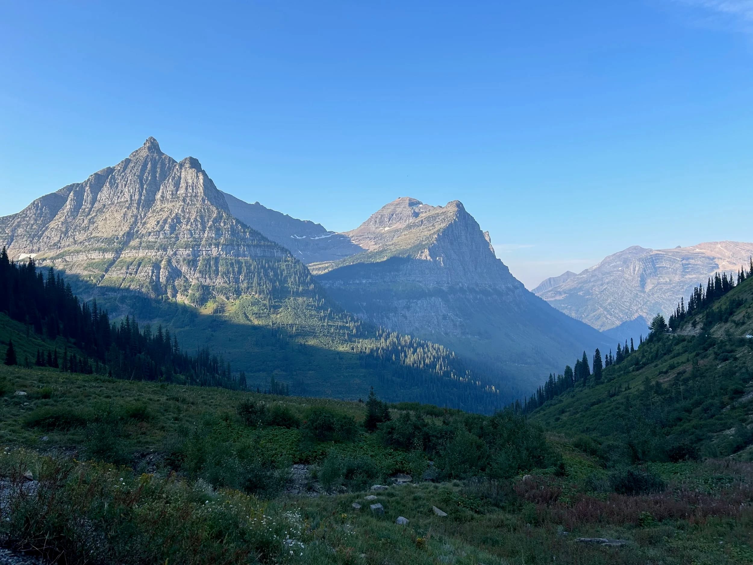 Trip Report: NW National Parks Loop
I left my job recently to take a much needed sabbatical and figure out what I’m doing next. A few weeks after my last day at work I embarked on what was to be a three week tour of NW-ish National Parks from Portland, to include Olympic, North Cascades, Glacier, Yellowstone, Grand Teton, Craters of the Moon, Lassen Volcanic, and Crater Lake.
I ended up missing Grand Tetons due to weather and I had to cut the trip short before I got to Lassen (family medical issue), so Lassen and Crater Lake remain unvisited.
Trip Dates: Sept 3 - Sept 16 (13 days)
Total Travel Miles: 3478 (does not include local miles for store runs, etc.)
Total Gallons of Gas Used: 82
Equipment: 2021 Benelli TRK502X Gaia GPS & Google Maps running on Sonim XP8 rugged Android phoneButler Motorcycle Maps (paper maps of best M/C roads in the country) iPhone 14 (main camera) Akaso Brave 7 helmet-mounted adventure camera Spot X satellite communicator and tracker Wolfman Luggage WP waterproof tank bag and saddle bags (no longer available) Watershed Colorado dry bag duffel (across the pillion seat) Kriega US-5 Drypack (tail bag) Kriega 3L hydration backpack (strapped to duffel, not worn)Marmot Ajax 2 tent Nemo hydrophobic down sleeping bag (non-mummy)Helinox ultralight cot MSR WhisperLite International stove
(Purchased in 1991 for my first moto trip: Detroit, MI to San Diego and back on an XT250)Gossamer Gear Bare Boxer bear-proof food canisters (two - one in each saddle bag)
Day 1 - Olympic National Park Date: Tuesday 9/3/2024
Destination: South Beach Campground, Olympic National Park
Travel Time: 4h 24m
Miles: 213Notes:
Planned to head west to Astoria then north from there, but left later than expected so headed up I-5 to US 12. I’ve driven/ridden that stretch of I-5 hundreds of times (starting in 1993). It’s boring and I hate it.
South Beach CG is first-come-first-served. I didn’t have issue getting a site. There is a long, tight loop of sites along the coastline, but I chose one of the sites further back near the bathrooms due to wind concerns. The bathroom building provided a sort of wind shelter for my site.
I used the heated grips on this leg; it was pretty chilly along the coast in the Olympic Peninsula. I almost didn’t install them, thinking I was being paranoid about the cold. I ended up using them a lot.
Day 2 - Ferry to Seattle / Burien Date: Wednesday 9/4/2024
Destination: Friend’s house in Burien, WA
Travel Time: 7h 30m
Miles: 199
Notes:
Slept well (thanks to Advil PM). I’ve not been sleeping well for more than a year. I’m really hoping to reset my sleep patterns with this trip. A good night’s sleep is one of my great joys and I feel like I’ve been robbed of that pleasure.
Used my Aeropress this morning for the first time ever. I’m hooked.
Headed up along US 101 through Port Angeles and then down to the Southworth ferry terminal near Port Orchard. Ferried across to Fauntleroy, which is just a few miles north my friend’s house in Burien. I’m always surprised at how long it takes to get from the Olympic Peninsula to the east side of Puget Sound (Seattle, etc.). With the ferry crossing (I love ferries) it took seven and a half hours to go 200 miles.
Discovered at my first stop of the day (just up 101 at the Kalaloch Campground, stopped to refill water) that the battery is quite weak and won’t start the bike if you leave the ignition on for even two minutes without the motor running. This would become a theme for the next few days. Fortunately, I have a jumper box and a permanent jump harness wired to the battery so jump starts are a quick operation.
Had a good evening with old friends.
Day 3 - North Cascades via Mountain Loop RoadDate: Thursday 9/5/2024
Destination: Newhalem Campground, North Cascades National Park
Travel Time: 4h 30m
Miles: 146Notes:
Slept well, on the couch. No pills needed.
I realized yesterday that my summer riding gloves (Rev’It Dune) were a size (or two) too small. Rev’It gloves fit really tight and I feel like I can never get it quite right. And yet, I love them. So, I stopped at a Cycle Gear in Bellevue to pick up something summer weight (Dirt 3) that fit better. They’re better, but maybe still one size too small. Such is life.
From Bellevue, I rode north and took the Mountain Loop Hwy then on up north to North Cascades. It was a hot ride. Still summer.
A small section of the Mountain Loop Road is dirt/gravel, which I didn’t realize. No biggie. Was just surprised (clearly I didn’t study my maps closely enough). When riding solo on a bike that weighs over 500 lbs., I tend to avoid planning much off-pavement riding. That’s what my DR-Z is for.
Day 4 - Newport, Washington via Winthrop Date: Friday 9/6/2024
Destination: Golden Spur Motor Inn, Newport, Washington
Travel Time: 8h
Miles: 308
Notes:
Slept just ok, even with Advil PM.
Pretty ride through North Cascades National Park and Colville National Forest. Didn’t do any backroads or hikes. Discovered (new to me) the town of Winthrop. Stopped for coffee at Sheri’s and resupplied on freeze-dried food at Cascades Outdoor Store.
The town of Newport is almost nothing, but, inexplicably, there’s an amazing restaurant (Brownell’s Place). Had dinner and a few ciders. Met and chatted with the owner/chef (she’s great). Listened to some live music. Then back to the motel.
Day 5 - New Battery in Kalispell Date: Saturday 9/7/2024
Destination: West Glacier KOA, West Glacier, MT
Travel Time: 8h 7m
Miles: 293
Notes:
Slept well on motel bed (on sleeping bag, not in the sheets). Another hot one.
Discovered that the water pump seal leaks oil. A quick post in the TRK Facebook group revealed that this is a common problem on this bike, and and easy fix. It’s apparently just a bad o-ring.
Battery has been getting continuously worse, and now requires I jump start the bike about every other start. Google Maps to the rescue: directions to the Batteries Plus in Kalispell, please. They don’t have an Odyssey AGM in the right size; the Duracell will have to do. (It’s been great.)
I set up camp at the West Glacier KOA, which will be my base for a few days. KOAs are their own little world. Very strange. Not really my thing, but the on-site laundry was handy.
After setting up camp I opened a cider and used the iPad to book a vehicle reservation for the next day to ride Going to the Sun Road, which I really wanted to do.
Day 6 - Going to the Sun RoadDate: Sunday 9/8/2024
Destination: Local Ride: West Glacier, Going to the Sun Road, Saint Mary, East Glacier
Travel Time: 5h 35m
Miles: 142Notes:
Quick breakfast and gas up in West Glacier before entering Going to the Sun Road.
Going to the Sun Road was stunning. This was the first point in the trip where I had tingles and was giddy at what I was seeing.
Took a very short hike along Saint Mary Lake. Again, I was beside myself with the beauty.
Lunch at the general store in Kiowa.
The rest of the ride back after East Glacier was meh, but I just kept thinking about how amazing what I’d seen in the morning had been.
Dinner at the KOA. Tacos from a cart (ok / not great, and a very weird guacamole) and a few glasses of wine from another cart. I asked about the guac and it turns out they make it in a food processor. Come on, people.
Day 7 - Ride to BozemanDate: Monday 9/9/2024
Destination: Friend’s house in Bozeman, Montana
Travel Time: ~ 8h (Gaia crashed near the end of the trip, but before getting to Bozeman)
Miles: ~ 400Notes:
Slept poorly again. No pills this time. Took some photos of my soft luggage setup to answer some questions in the TRK502X Facebook group. The saddle bags are from Wolfman Luggage, but I don’t think they make this waterproof line anymore. I use a duffel dry bag from Watershed across the top. A heat shield protects the side bag from exhaust heat.
Hazy, smoky ride most of the way. Very windy in places. This is where I first really started to feel how underpowered the TRK502 is. Really struggled in places.
Developed an engine-speed-sensitive squeak or rattle. Sounds like when a heat shield vibrates in resonance with engine vibration. Discovered that it’s a missing crash bar mounting bolt allowing the crash bar to rub against the frame.
Also noticed that there’s a resonant oscillation at speed that feels like the chain going bad (like it’s stretching unevenly).
First of several nights at a friend’s house in Bozeman (which, it turns out, is a pretty cool town). And there’s a hot tub…
Day 8 - Bike Maintenance & Hyalite ReservoirDate: Tuesday 9/10/2024
Destination: Local Ride: Hyalite Reservoir
Travel Time: not recorded
Miles: not recordedNotes:
Woke up to a smoky sunrise. I had the best night’s sleep I’ve had in years. This is was the whole point of this trip: to untangle my burnout and reclaim sleep as one of my joys. I wrote about it in my journal when I woke up. I hope this wasn’t a fluke.
Planned to replace the bolt that rattled loose from the crash bar, but instead discovered that it had actually severed off at the mount point. No fixing that on the road. Adjusted chain and moved on.
Lunch at Mountains Walking Brewery in Bozeman.
Rode up to Hyalite Reservoir. Pretty ride. Smoky still.
Soaked in hot tub after dinner.
Day 9 - North Yellowstone LoopDate: Wednesday 9/11/2024
Destination: Northern loop through Yellowstone National Park
Travel Time: 9h 36m
Miles: 272Notes:
Did a day trip from Bozeman down through the northern loop in Yellowstone, entering at Mammoth and taking the scenic route through Paradise Valley.
Saw elk, coyotes (I think), buffalo, and pronghorn.
Pretty ride, but cold in places. Used heated grips again.
Rode the loop through Mammoth Hot Springs (see video) at the end.
Coffee at Tumbleweed Bookstore & Cafe in Gardiner. I kind of dig Gardiner. Good vibe.
Had dinner at Mountains Walking Brewing. Rain and wind started. Lights flickered. Waited for rain to stop before riding back to the house.
Power out at the house due to high winds. This does not bode well for tomorrow.
Day 10 - Winter Weather in the ParksDate: Thursday 9/12/2024
Destination: Grand Teton National Park via West Yellowstone Pocatello, Idaho
Travel Time: 5h 40m
Miles: 201Notes:
Today was supposed to be a gorgeous ride through Yellowstone into Grand Teton National Park, and camping at Signal Mountain CG in the park. The weather had other ideas. It was pouring rain (and cold) all the way to West Yellowstone from Bozeman. By the time I got to West Yellowstone I was getting severe winter weather warnings on my phone calling for up to 3 (three!!) inches of snow accumulating in the high passes in the park. It’s bad enough in a car, but that’s a disaster waiting to happen on a motorcycle.
I parked my butt at Mountain Mama’s Cafe in West Yellowstone to warm up / dry off and decide what to do. I almost had myself convinced to push through when I realized that, even if I made it to the campground ok, I’d be setting up camp in the rain and I’d likely be miserable all night. Grand Teton would have to wait.
From West Yellowstone it’s easy to bail west into Idaho and get away from the park weather and elevations. So that’s what I did. It was not a pleasant ride, though. I was in torrential downpours all the way to Idaho Falls.
Arriving in Idaho Falls, I was exhausted and sure I could just find a room for the night. I dropped the bike at a roundabout (short-legged it coming to a stop; I knew it was going so I just rolled away). Guy behind me helped me pick it up. Then, there were no rooms because it was move in week for the two universities there (U of I, ISU). This would become a recurring theme.
I rode further to Blackfoot. Still no rooms.
I called ahead to Pocatello and got a room at a Red Lion there. I was never so happy to be off the bike.
No pictures this day. I couldn’t even get the action camera to turn on.
Day 11 - Craters of the Moon and EBR-1Date: Friday 9/13/2024
Destination: Craters of the Moon National Monument
Travel Time: 4h 20m
Miles: 124
Notes:
I wasn’t sure what my destination would be today but my plan was to do a little nuclear tourism, see Craters of the Moon, and then go somewhere from there. My schedule and day-plan was thrown off by missing Grand Teton National Park and spending a night in Pocatello, which was not on the itinerary at all.
Stopped in Atomic City. Not sure why; I was under the impression that Atomic City was the first city lit by nuclear engergy, but it was practically a ghost town. There are a few houses there, but as far as I could tell all of the business were shuttered. Except, maybe, for the race track; that looked like it might still get used.
Arco, it turns out, is the city celebrated as the first in the world to be lit by nuclear energy. Nothing special about the town, but they do a nice job of making City Hall photo-worthy.
Between Atomic City and Arco is EBR-1 (Experimental Breeder Reactor I) which was the world’s first breeder reactor. The EBR-1 exhibit was closed for the season, but in the lot next to it were some really interesting experimental nuclear heat-transfer jet engines that never made it out of the experimental phase (probably a good thing).
Craters of the Moon is pretty small. If you don’t do any of the walks, it’s literally just a 30 minute road loop. Still, it was an unexpected surprise and delight. I had no idea what to expect but I was positively chuffed at the experience. I noticed that the campground had open sites so I inquired at the entry booth. As luck would have it, the whole campground is first come / first serve. I decided to set up for the night. It’s good to be done early and have some time to read and not stress about making distance.
Day 12 - New Chain in Twin FallsDate: Saturday 9/14/2024
Destination: Battle Mountain, Nevada
Travel Time: 8h 52m
Miles: 335
Notes:
Beautiful morning in Craters of the Moon. While I was breaking camp a parade of classic cars came into the park to drive the loop. I got a picture of one Pontiac down the road in Carey at a gas station.
Carey ended up being an unplanned fork in the road for me. I discovered this morning that my chain was indeed stretching unevenly, and the oscillation I was feeling and hearing was the chain hum changing from a “loose” hum to a “tight” hum rapidly as the tight spot moved around the sprockets. I was supposed to continue west to Mountain Home and then south from there into Nevada. A very scenic route, according to my Butler map. But, between camp and the gas station I got pretty paranoid about the chain snapping at high speed, which, worst case, could lead to a fatal crash.
So I called ahead to a few motorcycle dealers in Mountain Home (on my planned route) to see if they could take me in and replace the chain. No dice. This is the downside of having an obscure motorcycle from an obscure marque - no one wants to work on it. Making matters worse this is an Italian-designed bike built in China, a fact which causes many people to lose the ability to think clearly. “It’s Chinese junk!” Not so. Next.
With Mountain Home out, I tried Twin Falls. My first call was to Adventure Motorsports, and the service manager there took me in with no hesitation. “How soon can you be here?” I didn’t get his name, but my hat’s off to him and his one tech working furiously on a Saturday to beat the 3pm closing time. He said during high season, they get about 15-20 out of town travelers per week who need something done, and they take them all in. I love to hear stuff like this. This shop is in it for the community. They have a nice showroom, too.
With a quality new chain installed, I got a burrito and a MexiCoke at a Mexican place and went on my way. I made it to Battle Mountain, NV, where I decide to get a room. Tomorrow I rejoin my planned scenic route. Day 13 - Desert Mountains in NV, CADate: Sunday 9/15/2024
Destination: Grizzly Campground, Lake Davis (near Portola, CA)
Travel Time: 7h
Miles: 307
Notes:
I love the northern Nevada landscape, and today’s ride didn’t disappoint. US Highway 50 is apparently known as “The Loneliest Highway” but everyone knows about it, so it’s not very lonely. However, after leaving Austin, NV headed west you can take Nevada Highway 722, which dips to the south and follows the old US 50 route. It was completely empty and the twisties through the passes were fun. Highly recommended.
Stopped in Fallon for gas and to find a Micro SD card for the action camera. Walmart to the rescue.
After Reno, I crossed into California and, I swear, it looks different. Norther California desert mountains are so beautiful.
Camped at a nearly empty campground on Lake Davis (very end of the season). The host warned me rain was coming tomorrow.
Day 14 - Unplanned Return HomeDate: Monday 9/16/2024
Destination: Summit Lake Campground, Lassen Volcanic National Park Portland, Oregon (Home)
Travel Time: 10h 32m
Miles: 538Notes:
Last week, my mom went into the hospital for a fairly routine procedure. My brother went to Michigan to help out, as needed, and he went back home to Arizona after she returned home and everything seemed settled.
This morning, while having coffee, I got a call that she’d gone back into the hospital with something that may or may not have been related to the procedure. It seemed like maybe things were ok, but maybe not.
I decided the best thing to do was head home so that I was near an airport if I needed to fly out to Michigan to help out.
I packed up camp and headed up US 395 toward home, via Klamath Falls. It was a pretty ride, but, once again, I found myself in rain most of the way to Klamath Falls.
I was pretty beat by the time I got to Klamath Falls and figured I’d just find a hotel room, get a hot shower, and finish the ride tomorrow.
But, once again, it was move-in week for the local university. Holiday Inn Express had a single room for $395. No thanks. Onward.
I never hit rain again after Klamath Falls, and after turning west onto Oregon Hwy 58 and starting to lose elevation into the Willamette Valley, the temperature starting rising, which was welcome.
Once I reached Eugene, there was no point in not just going all the way home, so that’s what I did.
I got two pictures: one at camp before the call, and one at my last gas stop, an hour and twenty minutes from home, with the moon rising.
A nice side effect of my early return home is that I was home for my birthday (tomorrow), so I had dinner with my kids and my wife, which was lovely.
I did end up flying to Michigan the next day, and was there for a bit. The best part? I got to make some meals for my mom and step dad. Everything seems ok with my mom for now.
Grand Teton, Lassen, and Crater Lake will be there, and now I have an excuse for another trip in the future.