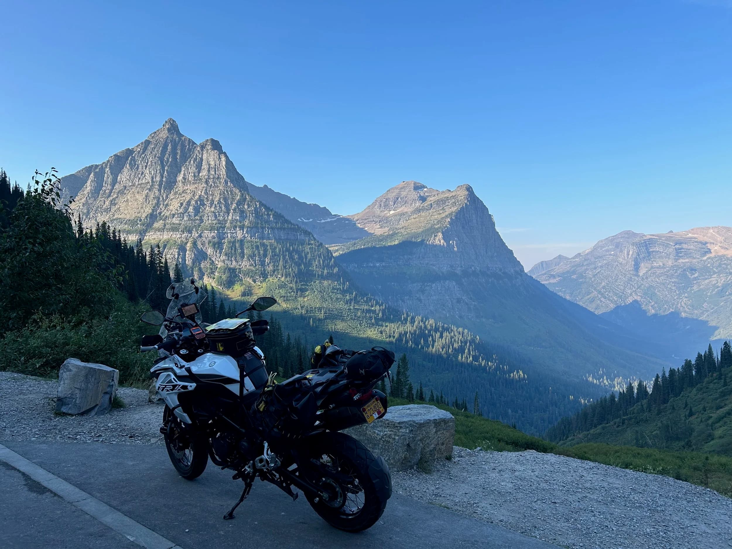 Trip Report: NW National Parks Loop
I left my job recently to take a much needed sabbatical and figure out what I’m doing next. A few weeks after my last day at work I embarked on what was to be a three week tour of NW-ish National Parks from Portland, to include Olympic, North Cascades, Glacier, Yellowstone, Grand Teton, Craters of the Moon, Lassen Volcanic, and Crater Lake.
I ended up missing Grand Tetons due to weather and I had to cut the trip short before I got to Lassen (family medical issue), so Lassen and Crater Lake remain unvisited.
Trip Dates: Sept 3 - Sept 16 (13 days)
Total Travel Miles: 3478 (does not include local miles for store runs, etc.)
Total Gallons of Gas Used: 82
Equipment: 2021 Benelli TRK502X Gaia GPS & Google Maps running on Sonim XP8 rugged Android phoneButler Motorcycle Maps (paper maps of best M/C roads in the country) iPhone 14 (main camera) Akaso Brave 7 helmet-mounted adventure camera Spot X satellite communicator and tracker Wolfman Luggage WP waterproof tank bag and saddle bags (no longer available) Watershed Colorado dry bag duffel (across the pillion seat) Kriega US-5 Drypack (tail bag) Kriega 3L hydration backpack (strapped to duffel, not worn)Marmot Ajax 2 tent Nemo hydrophobic down sleeping bag (non-mummy)Helinox ultralight cot MSR WhisperLite International stove
(Purchased in 1991 for my first moto trip: Detroit, MI to San Diego and back on an XT250)Gossamer Gear Bare Boxer bear-proof food canisters (two - one in each saddle bag)
Day 1 - Olympic National Park Date: Tuesday 9/3/2024
Destination: South Beach Campground, Olympic National Park
Travel Time: 4h 24m
Miles: 213Notes:
Planned to head west to Astoria then north from there, but left later than expected so headed up I-5 to US 12. I’ve driven/ridden that stretch of I-5 hundreds of times (starting in 1993). It’s boring and I hate it.
South Beach CG is first-come-first-served. I didn’t have issue getting a site. There is a long, tight loop of sites along the coastline, but I chose one of the sites further back near the bathrooms due to wind concerns. The bathroom building provided a sort of wind shelter for my site.
I used the heated grips on this leg; it was pretty chilly along the coast in the Olympic Peninsula. I almost didn’t install them, thinking I was being paranoid about the cold. I ended up using them a lot.
Day 2 - Ferry to Seattle / Burien Date: Wednesday 9/4/2024
Destination: Friend’s house in Burien, WA
Travel Time: 7h 30m
Miles: 199
Notes:
Slept well (thanks to Advil PM). I’ve not been sleeping well for more than a year. I’m really hoping to reset my sleep patterns with this trip. A good night’s sleep is one of my great joys and I feel like I’ve been robbed of that pleasure.
Used my Aeropress this morning for the first time ever. I’m hooked.
Headed up along US 101 through Port Angeles and then down to the Southworth ferry terminal near Port Orchard. Ferried across to Fauntleroy, which is just a few miles north my friend’s house in Burien. I’m always surprised at how long it takes to get from the Olympic Peninsula to the east side of Puget Sound (Seattle, etc.). With the ferry crossing (I love ferries) it took seven and a half hours to go 200 miles.
Discovered at my first stop of the day (just up 101 at the Kalaloch Campground, stopped to refill water) that the battery is quite weak and won’t start the bike if you leave the ignition on for even two minutes without the motor running. This would become a theme for the next few days. Fortunately, I have a jumper box and a permanent jump harness wired to the battery so jump starts are a quick operation.
Had a good evening with old friends.
Day 3 - North Cascades via Mountain Loop RoadDate: Thursday 9/5/2024
Destination: Newhalem Campground, North Cascades National Park
Travel Time: 4h 30m
Miles: 146Notes:
Slept well, on the couch. No pills needed.
I realized yesterday that my summer riding gloves (Rev’It Dune) were a size (or two) too small. Rev’It gloves fit really tight and I feel like I can never get it quite right. And yet, I love them. So, I stopped at a Cycle Gear in Bellevue to pick up something summer weight (Dirt 3) that fit better. They’re better, but maybe still one size too small. Such is life.
From Bellevue, I rode north and took the Mountain Loop Hwy then on up north to North Cascades. It was a hot ride. Still summer.
A small section of the Mountain Loop Road is dirt/gravel, which I didn’t realize. No biggie. Was just surprised (clearly I didn’t study my maps closely enough). When riding solo on a bike that weighs over 500 lbs., I tend to avoid planning much off-pavement riding. That’s what my DR-Z is for.
Day 4 - Newport, Washington via Winthrop Date: Friday 9/6/2024
Destination: Golden Spur Motor Inn, Newport, Washington
Travel Time: 8h
Miles: 308
Notes:
Slept just ok, even with Advil PM.
Pretty ride through North Cascades National Park and Colville National Forest. Didn’t do any backroads or hikes. Discovered (new to me) the town of Winthrop. Stopped for coffee at Sheri’s and resupplied on freeze-dried food at Cascades Outdoor Store.
The town of Newport is almost nothing, but, inexplicably, there’s an amazing restaurant (Brownell’s Place). Had dinner and a few ciders. Met and chatted with the owner/chef (she’s great). Listened to some live music. Then back to the motel.
Day 5 - New Battery in Kalispell Date: Saturday 9/7/2024
Destination: West Glacier KOA, West Glacier, MT
Travel Time: 8h 7m
Miles: 293
Notes:
Slept well on motel bed (on sleeping bag, not in the sheets). Another hot one.
Discovered that the water pump seal leaks oil. A quick post in the TRK Facebook group revealed that this is a common problem on this bike, and and easy fix. It’s apparently just a bad o-ring.
Battery has been getting continuously worse, and now requires I jump start the bike about every other start. Google Maps to the rescue: directions to the Batteries Plus in Kalispell, please. They don’t have an Odyssey AGM in the right size; the Duracell will have to do. (It’s been great.)
I set up camp at the West Glacier KOA, which will be my base for a few days. KOAs are their own little world. Very strange. Not really my thing, but the on-site laundry was handy.
After setting up camp I opened a cider and used the iPad to book a vehicle reservation for the next day to ride Going to the Sun Road, which I really wanted to do.
Day 6 - Going to the Sun RoadDate: Sunday 9/8/2024
Destination: Local Ride: West Glacier, Going to the Sun Road, Saint Mary, East Glacier
Travel Time: 5h 35m
Miles: 142Notes:
Quick breakfast and gas up in West Glacier before entering Going to the Sun Road.
Going to the Sun Road was stunning. This was the first point in the trip where I had tingles and was giddy at what I was seeing.
Took a very short hike along Saint Mary Lake. Again, I was beside myself with the beauty.
Lunch at the general store in Kiowa.
The rest of the ride back after East Glacier was meh, but I just kept thinking about how amazing what I’d seen in the morning had been.
Dinner at the KOA. Tacos from a cart (ok / not great, and a very weird guacamole) and a few glasses of wine from another cart. I asked about the guac and it turns out they make it in a food processor. Come on, people.
Day 7 - Ride to BozemanDate: Monday 9/9/2024
Destination: Friend’s house in Bozeman, Montana
Travel Time: ~ 8h (Gaia crashed near the end of the trip, but before getting to Bozeman)
Miles: ~ 400Notes:
Slept poorly again. No pills this time. Took some photos of my soft luggage setup to answer some questions in the TRK502X Facebook group. The saddle bags are from Wolfman Luggage, but I don’t think they make this waterproof line anymore. I use a duffel dry bag from Watershed across the top. A heat shield protects the side bag from exhaust heat.
Hazy, smoky ride most of the way. Very windy in places. This is where I first really started to feel how underpowered the TRK502 is. Really struggled in places.
Developed an engine-speed-sensitive squeak or rattle. Sounds like when a heat shield vibrates in resonance with engine vibration. Discovered that it’s a missing crash bar mounting bolt allowing the crash bar to rub against the frame.
Also noticed that there’s a resonant oscillation at speed that feels like the chain going bad (like it’s stretching unevenly).
First of several nights at a friend’s house in Bozeman (which, it turns out, is a pretty cool town). And there’s a hot tub…
Day 8 - Bike Maintenance & Hyalite ReservoirDate: Tuesday 9/10/2024
Destination: Local Ride: Hyalite Reservoir
Travel Time: not recorded
Miles: not recordedNotes:
Woke up to a smoky sunrise. I had the best night’s sleep I’ve had in years. This is was the whole point of this trip: to untangle my burnout and reclaim sleep as one of my joys. I wrote about it in my journal when I woke up. I hope this wasn’t a fluke.
Planned to replace the bolt that rattled loose from the crash bar, but instead discovered that it had actually severed off at the mount point. No fixing that on the road. Adjusted chain and moved on.
Lunch at Mountains Walking Brewery in Bozeman.
Rode up to Hyalite Reservoir. Pretty ride. Smoky still.
Soaked in hot tub after dinner.
Day 9 - North Yellowstone LoopDate: Wednesday 9/11/2024
Destination: Northern loop through Yellowstone National Park
Travel Time: 9h 36m
Miles: 272Notes:
Did a day trip from Bozeman down through the northern loop in Yellowstone, entering at Mammoth and taking the scenic route through Paradise Valley.
Saw elk, coyotes (I think), buffalo, and pronghorn.
Pretty ride, but cold in places. Used heated grips again.
Rode the loop through Mammoth Hot Springs (see video) at the end.
Coffee at Tumbleweed Bookstore & Cafe in Gardiner. I kind of dig Gardiner. Good vibe.
Had dinner at Mountains Walking Brewing. Rain and wind started. Lights flickered. Waited for rain to stop before riding back to the house.
Power out at the house due to high winds. This does not bode well for tomorrow.
Day 10 - Winter Weather in the ParksDate: Thursday 9/12/2024
Destination: Grand Teton National Park via West Yellowstone Pocatello, Idaho
Travel Time: 5h 40m
Miles: 201Notes:
Today was supposed to be a gorgeous ride through Yellowstone into Grand Teton National Park, and camping at Signal Mountain CG in the park. The weather had other ideas. It was pouring rain (and cold) all the way to West Yellowstone from Bozeman. By the time I got to West Yellowstone I was getting severe winter weather warnings on my phone calling for up to 3 (three!!) inches of snow accumulating in the high passes in the park. It’s bad enough in a car, but that’s a disaster waiting to happen on a motorcycle.
I parked my butt at Mountain Mama’s Cafe in West Yellowstone to warm up / dry off and decide what to do. I almost had myself convinced to push through when I realized that, even if I made it to the campground ok, I’d be setting up camp in the rain and I’d likely be miserable all night. Grand Teton would have to wait.
From West Yellowstone it’s easy to bail west into Idaho and get away from the park weather and elevations. So that’s what I did. It was not a pleasant ride, though. I was in torrential downpours all the way to Idaho Falls.
Arriving in Idaho Falls, I was exhausted and sure I could just find a room for the night. I dropped the bike at a roundabout (short-legged it coming to a stop; I knew it was going so I just rolled away). Guy behind me helped me pick it up. Then, there were no rooms because it was move in week for the two universities there (U of I, ISU). This would become a recurring theme.
I rode further to Blackfoot. Still no rooms.
I called ahead to Pocatello and got a room at a Red Lion there. I was never so happy to be off the bike.
No pictures this day. I couldn’t even get the action camera to turn on.
Day 11 - Craters of the Moon and EBR-1Date: Friday 9/13/2024
Destination: Craters of the Moon National Monument
Travel Time: 4h 20m
Miles: 124
Notes:
I wasn’t sure what my destination would be today but my plan was to do a little nuclear tourism, see Craters of the Moon, and then go somewhere from there. My schedule and day-plan was thrown off by missing Grand Teton National Park and spending a night in Pocatello, which was not on the itinerary at all.
Stopped in Atomic City. Not sure why; I was under the impression that Atomic City was the first city lit by nuclear engergy, but it was practically a ghost town. There are a few houses there, but as far as I could tell all of the business were shuttered. Except, maybe, for the race track; that looked like it might still get used.
Arco, it turns out, is the city celebrated as the first in the world to be lit by nuclear energy. Nothing special about the town, but they do a nice job of making City Hall photo-worthy.
Between Atomic City and Arco is EBR-1 (Experimental Breeder Reactor I) which was the world’s first breeder reactor. The EBR-1 exhibit was closed for the season, but in the lot next to it were some really interesting experimental nuclear heat-transfer jet engines that never made it out of the experimental phase (probably a good thing).
Craters of the Moon is pretty small. If you don’t do any of the walks, it’s literally just a 30 minute road loop. Still, it was an unexpected surprise and delight. I had no idea what to expect but I was positively chuffed at the experience. I noticed that the campground had open sites so I inquired at the entry booth. As luck would have it, the whole campground is first come / first serve. I decided to set up for the night. It’s good to be done early and have some time to read and not stress about making distance.
Day 12 - New Chain in Twin FallsDate: Saturday 9/14/2024
Destination: Battle Mountain, Nevada
Travel Time: 8h 52m
Miles: 335
Notes:
Beautiful morning in Craters of the Moon. While I was breaking camp a parade of classic cars came into the park to drive the loop. I got a picture of one Pontiac down the road in Carey at a gas station.
Carey ended up being an unplanned fork in the road for me. I discovered this morning that my chain was indeed stretching unevenly, and the oscillation I was feeling and hearing was the chain hum changing from a “loose” hum to a “tight” hum rapidly as the tight spot moved around the sprockets. I was supposed to continue west to Mountain Home and then south from there into Nevada. A very scenic route, according to my Butler map. But, between camp and the gas station I got pretty paranoid about the chain snapping at high speed, which, worst case, could lead to a fatal crash.
So I called ahead to a few motorcycle dealers in Mountain Home (on my planned route) to see if they could take me in and replace the chain. No dice. This is the downside of having an obscure motorcycle from an obscure marque - no one wants to work on it. Making matters worse this is an Italian-designed bike built in China, a fact which causes many people to lose the ability to think clearly. “It’s Chinese junk!” Not so. Next.
With Mountain Home out, I tried Twin Falls. My first call was to Adventure Motorsports, and the service manager there took me in with no hesitation. “How soon can you be here?” I didn’t get his name, but my hat’s off to him and his one tech working furiously on a Saturday to beat the 3pm closing time. He said during high season, they get about 15-20 out of town travelers per week who need something done, and they take them all in. I love to hear stuff like this. This shop is in it for the community. They have a nice showroom, too.
With a quality new chain installed, I got a burrito and a MexiCoke at a Mexican place and went on my way. I made it to Battle Mountain, NV, where I decide to get a room. Tomorrow I rejoin my planned scenic route. Day 13 - Desert Mountains in NV, CADate: Sunday 9/15/2024
Destination: Grizzly Campground, Lake Davis (near Portola, CA)
Travel Time: 7h
Miles: 307
Notes:
I love the northern Nevada landscape, and today’s ride didn’t disappoint. US Highway 50 is apparently known as “The Loneliest Highway” but everyone knows about it, so it’s not very lonely. However, after leaving Austin, NV headed west you can take Nevada Highway 722, which dips to the south and follows the old US 50 route. It was completely empty and the twisties through the passes were fun. Highly recommended.
Stopped in Fallon for gas and to find a Micro SD card for the action camera. Walmart to the rescue.
After Reno, I crossed into California and, I swear, it looks different. Norther California desert mountains are so beautiful.
Camped at a nearly empty campground on Lake Davis (very end of the season). The host warned me rain was coming tomorrow.
Day 14 - Unplanned Return HomeDate: Monday 9/16/2024
Destination: Summit Lake Campground, Lassen Volcanic National Park Portland, Oregon (Home)
Travel Time: 10h 32m
Miles: 538Notes:
Last week, my mom went into the hospital for a fairly routine procedure. My brother went to Michigan to help out, as needed, and he went back home to Arizona after she returned home and everything seemed settled.
This morning, while having coffee, I got a call that she’d gone back into the hospital with something that may or may not have been related to the procedure. It seemed like maybe things were ok, but maybe not.
I decided the best thing to do was head home so that I was near an airport if I needed to fly out to Michigan to help out.
I packed up camp and headed up US 395 toward home, via Klamath Falls. It was a pretty ride, but, once again, I found myself in rain most of the way to Klamath Falls.
I was pretty beat by the time I got to Klamath Falls and figured I’d just find a hotel room, get a hot shower, and finish the ride tomorrow.
But, once again, it was move-in week for the local university. Holiday Inn Express had a single room for $395. No thanks. Onward.
I never hit rain again after Klamath Falls, and after turning west onto Oregon Hwy 58 and starting to lose elevation into the Willamette Valley, the temperature starting rising, which was welcome.
Once I reached Eugene, there was no point in not just going all the way home, so that’s what I did.
I got two pictures: one at camp before the call, and one at my last gas stop, an hour and twenty minutes from home, with the moon rising.
A nice side effect of my early return home is that I was home for my birthday (tomorrow), so I had dinner with my kids and my wife, which was lovely.
I did end up flying to Michigan the next day, and was there for a bit. The best part? I got to make some meals for my mom and step dad. Everything seems ok with my mom for now.
Grand Teton, Lassen, and Crater Lake will be there, and now I have an excuse for another trip in the future.