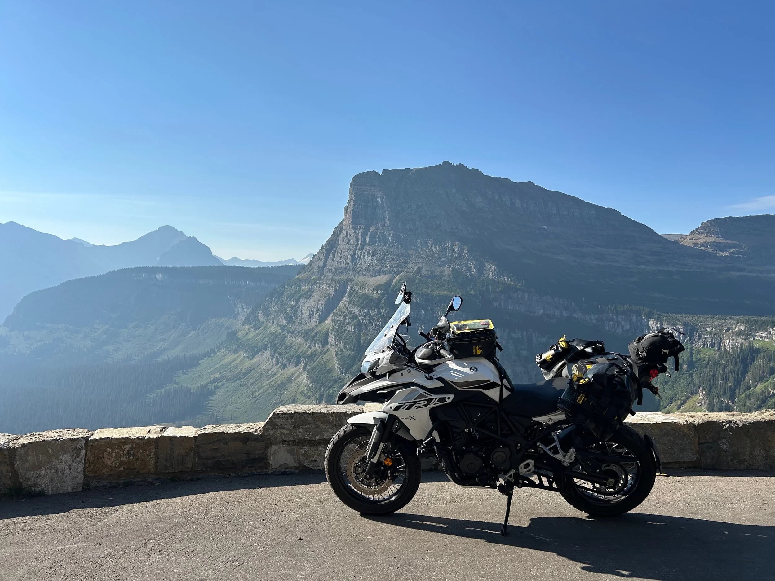 Trip Report: NW National Parks Loop
I left my job recently to take a much needed sabbatical and figure out what I’m doing next. A few weeks after my last day at work I embarked on what was to be a three week tour of NW-ish National Parks from Portland, to include Olympic, North Cascades, Glacier, Yellowstone, Grand Teton, Craters of the Moon, Lassen Volcanic, and Crater Lake.
I ended up missing Grand Tetons due to weather and I had to cut the trip short before I got to Lassen (family medical issue), so Lassen and Crater Lake remain unvisited.
Trip Dates: Sept 3 - Sept 16 (13 days)
Total Travel Miles: 3478 (does not include local miles for store runs, etc.)
Total Gallons of Gas Used: 82
Equipment: 2021 Benelli TRK502X Gaia GPS & Google Maps running on Sonim XP8 rugged Android phoneButler Motorcycle Maps (paper maps of best M/C roads in the country) iPhone 14 (main camera) Akaso Brave 7 helmet-mounted adventure camera Spot X satellite communicator and tracker Wolfman Luggage WP waterproof tank bag and saddle bags (no longer available) Watershed Colorado dry bag duffel (across the pillion seat) Kriega US-5 Drypack (tail bag) Kriega 3L hydration backpack (strapped to duffel, not worn)Marmot Ajax 2 tent Nemo hydrophobic down sleeping bag (non-mummy)Helinox ultralight cot MSR WhisperLite International stove
(Purchased in 1991 for my first moto trip: Detroit, MI to San Diego and back on an XT250)Gossamer Gear Bare Boxer bear-proof food canisters (two - one in each saddle bag)
Day 1 - Olympic National Park Date: Tuesday 9/3/2024
Destination: South Beach Campground, Olympic National Park
Travel Time: 4h 24m
Miles: 213Notes:
Planned to head west to Astoria then north from there, but left later than expected so headed up I-5 to US 12. I’ve driven/ridden that stretch of I-5 hundreds of times (starting in 1993). It’s boring and I hate it.
South Beach CG is first-come-first-served. I didn’t have issue getting a site. There is a long, tight loop of sites along the coastline, but I chose one of the sites further back near the bathrooms due to wind concerns. The bathroom building provided a sort of wind shelter for my site.
I used the heated grips on this leg; it was pretty chilly along the coast in the Olympic Peninsula. I almost didn’t install them, thinking I was being paranoid about the cold. I ended up using them a lot.
Day 2 - Ferry to Seattle / Burien Date: Wednesday 9/4/2024
Destination: Friend’s house in Burien, WA
Travel Time: 7h 30m
Miles: 199
Notes:
Slept well (thanks to Advil PM). I’ve not been sleeping well for more than a year. I’m really hoping to reset my sleep patterns with this trip. A good night’s sleep is one of my great joys and I feel like I’ve been robbed of that pleasure.
Used my Aeropress this morning for the first time ever. I’m hooked.
Headed up along US 101 through Port Angeles and then down to the Southworth ferry terminal near Port Orchard. Ferried across to Fauntleroy, which is just a few miles north my friend’s house in Burien. I’m always surprised at how long it takes to get from the Olympic Peninsula to the east side of Puget Sound (Seattle, etc.). With the ferry crossing (I love ferries) it took seven and a half hours to go 200 miles.
Discovered at my first stop of the day (just up 101 at the Kalaloch Campground, stopped to refill water) that the battery is quite weak and won’t start the bike if you leave the ignition on for even two minutes without the motor running. This would become a theme for the next few days. Fortunately, I have a jumper box and a permanent jump harness wired to the battery so jump starts are a quick operation.
Had a good evening with old friends.
Day 3 - North Cascades via Mountain Loop RoadDate: Thursday 9/5/2024
Destination: Newhalem Campground, North Cascades National Park
Travel Time: 4h 30m
Miles: 146Notes:
Slept well, on the couch. No pills needed.
I realized yesterday that my summer riding gloves (Rev’It Dune) were a size (or two) too small. Rev’It gloves fit really tight and I feel like I can never get it quite right. And yet, I love them. So, I stopped at a Cycle Gear in Bellevue to pick up something summer weight (Dirt 3) that fit better. They’re better, but maybe still one size too small. Such is life.
From Bellevue, I rode north and took the Mountain Loop Hwy then on up north to North Cascades. It was a hot ride. Still summer.
A small section of the Mountain Loop Road is dirt/gravel, which I didn’t realize. No biggie. Was just surprised (clearly I didn’t study my maps closely enough). When riding solo on a bike that weighs over 500 lbs., I tend to avoid planning much off-pavement riding. That’s what my DR-Z is for.
Day 4 - Newport, Washington via Winthrop Date: Friday 9/6/2024
Destination: Golden Spur Motor Inn, Newport, Washington
Travel Time: 8h
Miles: 308
Notes:
Slept just ok, even with Advil PM.
Pretty ride through North Cascades National Park and Colville National Forest. Didn’t do any backroads or hikes. Discovered (new to me) the town of Winthrop. Stopped for coffee at Sheri’s and resupplied on freeze-dried food at Cascades Outdoor Store.
The town of Newport is almost nothing, but, inexplicably, there’s an amazing restaurant (Brownell’s Place). Had dinner and a few ciders. Met and chatted with the owner/chef (she’s great). Listened to some live music. Then back to the motel.
Day 5 - New Battery in Kalispell Date: Saturday 9/7/2024
Destination: West Glacier KOA, West Glacier, MT
Travel Time: 8h 7m
Miles: 293
Notes:
Slept well on motel bed (on sleeping bag, not in the sheets). Another hot one.
Discovered that the water pump seal leaks oil. A quick post in the TRK Facebook group revealed that this is a common problem on this bike, and and easy fix. It’s apparently just a bad o-ring.
Battery has been getting continuously worse, and now requires I jump start the bike about every other start. Google Maps to the rescue: directions to the Batteries Plus in Kalispell, please. They don’t have an Odyssey AGM in the right size; the Duracell will have to do. (It’s been great.)
I set up camp at the West Glacier KOA, which will be my base for a few days. KOAs are their own little world. Very strange. Not really my thing, but the on-site laundry was handy.
After setting up camp I opened a cider and used the iPad to book a vehicle reservation for the next day to ride Going to the Sun Road, which I really wanted to do.
Day 6 - Going to the Sun RoadDate: Sunday 9/8/2024
Destination: Local Ride: West Glacier, Going to the Sun Road, Saint Mary, East Glacier
Travel Time: 5h 35m
Miles: 142Notes:
Quick breakfast and gas up in West Glacier before entering Going to the Sun Road.
Going to the Sun Road was stunning. This was the first point in the trip where I had tingles and was giddy at what I was seeing.
Took a very short hike along Saint Mary Lake. Again, I was beside myself with the beauty.
Lunch at the general store in Kiowa.
The rest of the ride back after East Glacier was meh, but I just kept thinking about how amazing what I’d seen in the morning had been.
Dinner at the KOA. Tacos from a cart (ok / not great, and a very weird guacamole) and a few glasses of wine from another cart. I asked about the guac and it turns out they make it in a food processor. Come on, people.
Day 7 - Ride to BozemanDate: Monday 9/9/2024
Destination: Friend’s house in Bozeman, Montana
Travel Time: ~ 8h (Gaia crashed near the end of the trip, but before getting to Bozeman)
Miles: ~ 400Notes:
Slept poorly again. No pills this time. Took some photos of my soft luggage setup to answer some questions in the TRK502X Facebook group. The saddle bags are from Wolfman Luggage, but I don’t think they make this waterproof line anymore. I use a duffel dry bag from Watershed across the top. A heat shield protects the side bag from exhaust heat.
Hazy, smoky ride most of the way. Very windy in places. This is where I first really started to feel how underpowered the TRK502 is. Really struggled in places.
Developed an engine-speed-sensitive squeak or rattle. Sounds like when a heat shield vibrates in resonance with engine vibration. Discovered that it’s a missing crash bar mounting bolt allowing the crash bar to rub against the frame.
Also noticed that there’s a resonant oscillation at speed that feels like the chain going bad (like it’s stretching unevenly).
First of several nights at a friend’s house in Bozeman (which, it turns out, is a pretty cool town). And there’s a hot tub…
Day 8 - Bike Maintenance & Hyalite ReservoirDate: Tuesday 9/10/2024
Destination: Local Ride: Hyalite Reservoir
Travel Time: not recorded
Miles: not recordedNotes:
Woke up to a smoky sunrise. I had the best night’s sleep I’ve had in years. This is was the whole point of this trip: to untangle my burnout and reclaim sleep as one of my joys. I wrote about it in my journal when I woke up. I hope this wasn’t a fluke.
Planned to replace the bolt that rattled loose from the crash bar, but instead discovered that it had actually severed off at the mount point. No fixing that on the road. Adjusted chain and moved on.
Lunch at Mountains Walking Brewery in Bozeman.
Rode up to Hyalite Reservoir. Pretty ride. Smoky still.
Soaked in hot tub after dinner.
Day 9 - North Yellowstone LoopDate: Wednesday 9/11/2024
Destination: Northern loop through Yellowstone National Park
Travel Time: 9h 36m
Miles: 272Notes:
Did a day trip from Bozeman down through the northern loop in Yellowstone, entering at Mammoth and taking the scenic route through Paradise Valley.
Saw elk, coyotes (I think), buffalo, and pronghorn.
Pretty ride, but cold in places. Used heated grips again.
Rode the loop through Mammoth Hot Springs (see video) at the end.
Coffee at Tumbleweed Bookstore & Cafe in Gardiner. I kind of dig Gardiner. Good vibe.
Had dinner at Mountains Walking Brewing. Rain and wind started. Lights flickered. Waited for rain to stop before riding back to the house.
Power out at the house due to high winds. This does not bode well for tomorrow.
Day 10 - Winter Weather in the ParksDate: Thursday 9/12/2024
Destination: Grand Teton National Park via West Yellowstone Pocatello, Idaho
Travel Time: 5h 40m
Miles: 201Notes:
Today was supposed to be a gorgeous ride through Yellowstone into Grand Teton National Park, and camping at Signal Mountain CG in the park. The weather had other ideas. It was pouring rain (and cold) all the way to West Yellowstone from Bozeman. By the time I got to West Yellowstone I was getting severe winter weather warnings on my phone calling for up to 3 (three!!) inches of snow accumulating in the high passes in the park. It’s bad enough in a car, but that’s a disaster waiting to happen on a motorcycle.
I parked my butt at Mountain Mama’s Cafe in West Yellowstone to warm up / dry off and decide what to do. I almost had myself convinced to push through when I realized that, even if I made it to the campground ok, I’d be setting up camp in the rain and I’d likely be miserable all night. Grand Teton would have to wait.
From West Yellowstone it’s easy to bail west into Idaho and get away from the park weather and elevations. So that’s what I did. It was not a pleasant ride, though. I was in torrential downpours all the way to Idaho Falls.
Arriving in Idaho Falls, I was exhausted and sure I could just find a room for the night. I dropped the bike at a roundabout (short-legged it coming to a stop; I knew it was going so I just rolled away). Guy behind me helped me pick it up. Then, there were no rooms because it was move in week for the two universities there (U of I, ISU). This would become a recurring theme.
I rode further to Blackfoot. Still no rooms.
I called ahead to Pocatello and got a room at a Red Lion there. I was never so happy to be off the bike.
No pictures this day. I couldn’t even get the action camera to turn on.
Day 11 - Craters of the Moon and EBR-1Date: Friday 9/13/2024
Destination: Craters of the Moon National Monument
Travel Time: 4h 20m
Miles: 124
Notes:
I wasn’t sure what my destination would be today but my plan was to do a little nuclear tourism, see Craters of the Moon, and then go somewhere from there. My schedule and day-plan was thrown off by missing Grand Teton National Park and spending a night in Pocatello, which was not on the itinerary at all.
Stopped in Atomic City. Not sure why; I was under the impression that Atomic City was the first city lit by nuclear engergy, but it was practically a ghost town. There are a few houses there, but as far as I could tell all of the business were shuttered. Except, maybe, for the race track; that looked like it might still get used.
Arco, it turns out, is the city celebrated as the first in the world to be lit by nuclear energy. Nothing special about the town, but they do a nice job of making City Hall photo-worthy.
Between Atomic City and Arco is EBR-1 (Experimental Breeder Reactor I) which was the world’s first breeder reactor. The EBR-1 exhibit was closed for the season, but in the lot next to it were some really interesting experimental nuclear heat-transfer jet engines that never made it out of the experimental phase (probably a good thing).
Craters of the Moon is pretty small. If you don’t do any of the walks, it’s literally just a 30 minute road loop. Still, it was an unexpected surprise and delight. I had no idea what to expect but I was positively chuffed at the experience. I noticed that the campground had open sites so I inquired at the entry booth. As luck would have it, the whole campground is first come / first serve. I decided to set up for the night. It’s good to be done early and have some time to read and not stress about making distance.
Day 12 - New Chain in Twin FallsDate: Saturday 9/14/2024
Destination: Battle Mountain, Nevada
Travel Time: 8h 52m
Miles: 335
Notes:
Beautiful morning in Craters of the Moon. While I was breaking camp a parade of classic cars came into the park to drive the loop. I got a picture of one Pontiac down the road in Carey at a gas station.
Carey ended up being an unplanned fork in the road for me. I discovered this morning that my chain was indeed stretching unevenly, and the oscillation I was feeling and hearing was the chain hum changing from a “loose” hum to a “tight” hum rapidly as the tight spot moved around the sprockets. I was supposed to continue west to Mountain Home and then south from there into Nevada. A very scenic route, according to my Butler map. But, between camp and the gas station I got pretty paranoid about the chain snapping at high speed, which, worst case, could lead to a fatal crash.
So I called ahead to a few motorcycle dealers in Mountain Home (on my planned route) to see if they could take me in and replace the chain. No dice. This is the downside of having an obscure motorcycle from an obscure marque - no one wants to work on it. Making matters worse this is an Italian-designed bike built in China, a fact which causes many people to lose the ability to think clearly. “It’s Chinese junk!” Not so. Next.
With Mountain Home out, I tried Twin Falls. My first call was to Adventure Motorsports, and the service manager there took me in with no hesitation. “How soon can you be here?” I didn’t get his name, but my hat’s off to him and his one tech working furiously on a Saturday to beat the 3pm closing time. He said during high season, they get about 15-20 out of town travelers per week who need something done, and they take them all in. I love to hear stuff like this. This shop is in it for the community. They have a nice showroom, too.
With a quality new chain installed, I got a burrito and a MexiCoke at a Mexican place and went on my way. I made it to Battle Mountain, NV, where I decide to get a room. Tomorrow I rejoin my planned scenic route. Day 13 - Desert Mountains in NV, CADate: Sunday 9/15/2024
Destination: Grizzly Campground, Lake Davis (near Portola, CA)
Travel Time: 7h
Miles: 307
Notes:
I love the northern Nevada landscape, and today’s ride didn’t disappoint. US Highway 50 is apparently known as “The Loneliest Highway” but everyone knows about it, so it’s not very lonely. However, after leaving Austin, NV headed west you can take Nevada Highway 722, which dips to the south and follows the old US 50 route. It was completely empty and the twisties through the passes were fun. Highly recommended.
Stopped in Fallon for gas and to find a Micro SD card for the action camera. Walmart to the rescue.
After Reno, I crossed into California and, I swear, it looks different. Norther California desert mountains are so beautiful.
Camped at a nearly empty campground on Lake Davis (very end of the season). The host warned me rain was coming tomorrow.
Day 14 - Unplanned Return HomeDate: Monday 9/16/2024
Destination: Summit Lake Campground, Lassen Volcanic National Park Portland, Oregon (Home)
Travel Time: 10h 32m
Miles: 538Notes:
Last week, my mom went into the hospital for a fairly routine procedure. My brother went to Michigan to help out, as needed, and he went back home to Arizona after she returned home and everything seemed settled.
This morning, while having coffee, I got a call that she’d gone back into the hospital with something that may or may not have been related to the procedure. It seemed like maybe things were ok, but maybe not.
I decided the best thing to do was head home so that I was near an airport if I needed to fly out to Michigan to help out.
I packed up camp and headed up US 395 toward home, via Klamath Falls. It was a pretty ride, but, once again, I found myself in rain most of the way to Klamath Falls.
I was pretty beat by the time I got to Klamath Falls and figured I’d just find a hotel room, get a hot shower, and finish the ride tomorrow.
But, once again, it was move-in week for the local university. Holiday Inn Express had a single room for $395. No thanks. Onward.
I never hit rain again after Klamath Falls, and after turning west onto Oregon Hwy 58 and starting to lose elevation into the Willamette Valley, the temperature starting rising, which was welcome.
Once I reached Eugene, there was no point in not just going all the way home, so that’s what I did.
I got two pictures: one at camp before the call, and one at my last gas stop, an hour and twenty minutes from home, with the moon rising.
A nice side effect of my early return home is that I was home for my birthday (tomorrow), so I had dinner with my kids and my wife, which was lovely.
I did end up flying to Michigan the next day, and was there for a bit. The best part? I got to make some meals for my mom and step dad. Everything seems ok with my mom for now.
Grand Teton, Lassen, and Crater Lake will be there, and now I have an excuse for another trip in the future.