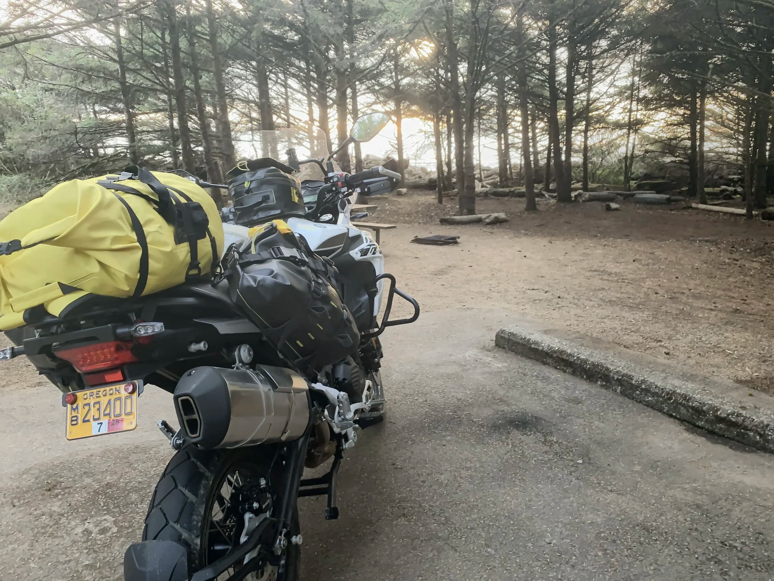 Trip Report: Portland to Olympic Peninsula to Orcas Island
If you follow me on Instagram, you know I purchased a 2021 Benelli TRK502X in July. I just completed my first overnight trip with the new Benelli, doing 7 nights / 8 days from Portland, up the Olympic Peninsula, over to Bellingham and then finally to Orcas Island.
The plan was to camp most or all nights until my last two nights on Orcas, where I had a small waterfront cottage rented right in Orcas Village, where the ferry lands. After three nights of camping, however, I realized I can’t really do the “thin air pad on the ground” thing anymore (I’d be 50 in a week, after all!). My back was killing me and I was not sleeping well, making the following day’s ride less enjoyable at best, and probably also less safe.
So, instead of 5 nights of camping, I did three and then found a cheap motel in Port Angeles, figuring I’d camp the next night and then do my two nights in the cottage. As it happened, most of the next day was rain and the forecast was rain all night and into the morning, so I ended up in a hotel in Bellingham to avoid setting up and breaking down camp in the rain. I can do it. Have done it. But if money is no object and there is lodging available, why be miserable?
The route I planned was intended to get me familiar with the TRK’s manners while allowing for the fact that I’d be riding solo and really didn’t want to get into trouble that I couldn’t get myself out of. The 502X, despite being a 500cc bike, is not light. Curb weight is listed as 518 lbs (dry is 470). So, I favored two lane highways, but included some backcountry single lane roads that were a mix of pavement and gravel.
Here’s my trip report. Day 1Planned / Actual Destination: Cape Disappointment State Park
Planned / Actual Accommodation: Camping
Planned / Actual Miles: 201 / 212
Planned Route: Tigard to Seaside via the Nestucca River Backcountry Byway; Seaside to Cape Disappointment via US 101.
Route NotesI let Google guide me to Carlton from Tigard (home base). On Gaia GPS, I had planned a route that followed the Nestucca River Backcountry Byway from Carlton to Beaver. Unfortunately, there was a detour after McGuire Reservoir (the body of water at the left edge of the right third of the map above) that took me well south down to Bell Mountain along Bald Mountain Rd before heading back north again and rejoining the Nestucca River Rd near Thune Mouintain. Basically, I missed at least half of the scenic route I was hoping for. I wasn’t sure how far the closure went on Nestucca River Rd, and I was still getting the hang of using Gaia to both see where I was, and plan where I wanted to go…so I just followed the signs for the detour. The detour was nice, but it wasn’t the Nestucca River . Most of the route was paved single lane forest road, with a small section of gravel thrown in before the detour.
Once to Beaver, I just rode south on 101 until I saw the signs for Pacific City. Lunch at Pelican Brewery. (I’m not a fan of their new orange grate picnic table outdoor seating.)
After lunch, I rode straight up 101 through Astoria and across to Ilwaco, where I had a reservation to camp at Cape Disappointment. Great spot, right up against the beach (with some trees and brush to break the wind). Camp NotesCape Disappointment was filled mostly with campers pulled by pickup trucks, and my site was nestled between two of them. Most people were friendly. The guy on the north side came over right away to ask about the bike. He’d never seen or heard of Benelli. The guy on the south side came over several times. It’s like he kept looking for excuses to come over and talk more. He even offered me dinner (red beans and rice, with sausage). I accepted. The next morning, he came over with pictures of places I should see in Olympic National Park. The wife of the guy on the north side came over just before I departed for the day’s travels. “Looks like a lot of fun. Nice bike. Reminds me of when we used to backpack. Now we have this thing,” (she gestured to her trailer).
The site itself was great. It was wooded, and sheltered from the beach winds with a thin band of trees and brush, plus a wall of driftwood you had to navigate through and over to get to the beach. The beach itself was gorgeous. Gear NotesI’d read that my trusty MSR Whisperlite Internationale (purchased in 1991) can run on unleaded gasoline just as easily as white gas. Since this kind of moto touring is about going as light and simply as possible, I figured I’d just run unleaded gas instead of bringing white gas. This way, I’d have 1.5 liters of spare gas plus whatever was in my stove bottle in the event that I ran out of gas on the road. Seemed like a great idea.
The reality, as I found out, is that gasoline burns very dirty compared to white gas. It lit, no problem, but the stove was left covered in black soot after a single burn and everything ends up smelling like gasoline. I never realized how much I’d want to smell white gas. So, next trip I’ll ditch the gasoline and go back to white gas.
Also, I threw out my deodorant and body soap before bed. Because I’m using soft bags (not hard aluminum cases) all of my food, toothpaste, and other smelly items need to fit into a small bear canister that fits inside one of my soft bags (keeps rodents out, even if there are no bears). To save space, the stove needs to fit in the bear canister, too. The deodorant and soap simply didn’t fit. So, off they went. Besides, I use Dr. Bronner’s as my dish soap. If I found a shower, I could use that.
Day 2Planned / Actual Destination: South Beach Campground
Planned / Actual Accommodation: Camping
Planned / Actual Miles: 231 / 219
Planned Route: Cape Disappointment up around the Long Beach Peninsula, to South Beach Campground via Raymond, Grayland, Aberdeen, Moclips, Lake Quinault (I skipped the loop around the Long Beach Peninsula)Route NotesToday was a very nice ride. Two lane highway all the way, with a good chunk of it along the coast. I had planned to do a loop up the Long Beach Peninsula, but decided to skip it to save time after spending some time in the morning exploring Cape Disappointment State Park. My destination, South Beach Campground, is first come / first serve and I wasn’t sure how busy it would be, so I didn’t want to arrive too late.
Finding lunch turned out to be a problem. I was avoiding sketchy looking places because the mask wearing seemed to be a problem. I wasn’t looking for conflict. Along the way I discovered the town of Seabrook, which appears to be a vacation shopping mall built specifically to separate you both from reality and your money. Not my kind of place, though I did look to see if there was a place I could eat. Everything looked too fancy for me to roll up in my full moto suit and boots. Where’s a good taco truck when you need one?
I ended up eating in a gas station convenience store (You and I Market) parking lot in Pacific Beach, just up the road from Seabrook with a bunch of day laborers picking up their afternoon tallboys. Gear NotesFor day two, I used Gaia GPS’s route planning feature to set my path to South Beach. It’s quite easy once you figure out the combination of gestures and long-presses (I needed a YouTube video). One caveat is that you either need a data connection (Wi-Fi or mobile data) to be able to do it (if you want the route to snap to a road or trail, which is quite handy), or you need to have downloaded all the map areas and route planning data ahead of time. Ordinarily, this wouldn’t be a problem, but I had brought along two phones: my iPhone (which is my regular phone) for pictures and communication (it would ride in my chest pocket); and Goggle Pixel 3 I’d purchased to use only for navigation (it would be mounted to the handlebars). I don’t have data for the Pixel.
This turned out to be a problem because I hadn’t downloaded all the map areas and route planning data for my trip onto the Pixel (whereas I had downloaded it all to the iPhone). So, I switched to navigating (still with Gaia GPS) on my iPhone and taking pictures with the Pixel for this leg of the trip, hoping I’d get good Wi-Fi at some point which would allow me to download the data I needed onto the Pixel so I could switch back.
This single day of using the iPhone as my navigation device fried the camera. Two days later, Apple published this.
I still really like having two phones on a trip. (I also have a Spot X satellite communicator for off-grid communication.) It’s nice to have one in the pocket that can come out for a quick picture. It’s also nice to have an emergency backup. It would be nice to have a data plan for the nav phone. Short of that, I just need to be better about downloading map areas and routing data ahead of time (and not using my iPhone for nav). Camp NotesSouth Beach Campground is right on the water, and it’s first-come, first-served. The weather was good, and I felt lucky to get a spot. There were several spots available as it turned out. As I was riding around trying to choose which spot to take, there was a couple with a pickup camper waving me in next to them. This was a first. “We ride!” they exclaimed. So that’s where I set up camp.
The guy’s name was Steve Miller. He sells CBD products online. Seems on brand. They were an amazingly friendly couple, actually. Both ride BMW’s and Steve, especially, was really curious and enthusiastic about the TRK. The bike was really turning out to be a conversation starter. He came over several different times while I was setting up camp and making dinner to ask questions or share info about riding groups he’s a part of. It was really quite welcome.
In the morning they gifted me some carrot zucchini bread for breakfast and then broke camp and pulled out well before I did.