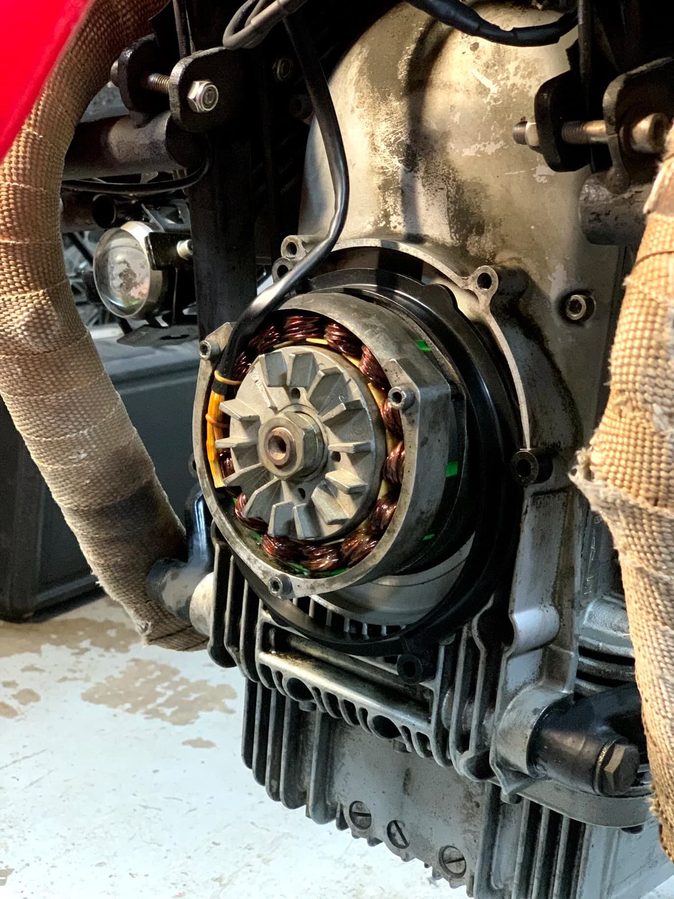State of the Quota, pt. One
If you’ve read my first post or the About section, you know I’m planning on riding a Moto Guzzi Quota 1100ES on the first several sections of the Nevada BDR (along with my brother on his KLR 650) in spring 2020. There’s a lot of prep to do before then, but let’s start with the State of the Quota.
The bike in question was made in Mandello del Lario, Italy at the historic Moto Guzzi factory. Moto Guzzi, established in 1921, is the oldest European motorcycle works in continuous production. The Quota 1100ES was made from 1998 to 2001 but was only sent to the United States, in very small quantities, for the 1999 and 2000 model years. I can’t find a definitive source, but the consensus seems to be that only about 130 units total were sent to the US. The one I own is model year 2000 and is the only one I’ve ever seen in real life. It’s probably a safe bet that only half of those original US-bound bikes are still on the road. It’s a very small club.
The good news, though, is that, although the frame and body components are entirely unique, the motor and drivetrain are assembled from common Guzzi parts and are easy to come by. That said, it would really be smart to buy a second Quota as a parts donor bike. Some things, like shift levers and body parts, are getting harder to find (and much more expensive). The club is getting smaller.
I acquired my Quota in the spring of 2018 from my buddy Patrick in Seattle who collects, builds and barters all things Moto Guzzi. I’m not sure how or why he had it. He’s not an “adventure” rider. I think he just thought it was cool. Which it is.
The bike needed a bit of work when I bought it and part of the deal was that we’d do that work together, in his garage, before I trailered it back home to Portland. So, over the course of a weekend, we replaced a head that had a stripped out exhaust stud with a spare Patrick had laying around (see note above about collecting and bartering), swapped out the middle muffler for straight-through Y-pipe, changed the fluids, and adjusted the valves.
Sounds all very simple, but there was a hiccup. After installing the replacement head and moving on to reassembly and connection of the accessory components we discovered that there was no place in the new head for the head temp sensor, which is used by the electronic fuel injection (EFI) system. In the original head, there’s a threaded bore into which the threaded end of the brass sensor unit is screwed. No such bore on the donor head.
After some calling around to Patrick’s Moto Guzzi mechanic friends, it was decided that the brass heat sink of the temp sensor simply needs to be in contact with the head somewhere and that would provide enough thermal transfer to give the EFI the engine temp info it needs to adjust fuel delivery properly. So, Patrick drilled some small holes into the cooling fins on the inboard side of the head and lashed the temp sensor assembly to the head sideways, brass to aluminum. It seems to work. It’s been working for two years. All the same it’s not like me to jury-rig something like this, and it bugs me constantly. Even more so now that I’ve admitted my mechanical transgression publicly.
You’ll note in a later post that I have stainless safety wire on my packing list…and you’ll know why.
With that out of the way, here’s a catalog of what’s been done to date and the current state of the Quota. Mods & Repairs To Date Electrical Battery (upgraded to Odyssey AGM) Stator (replaced failing unit)Regulator / Rectifier (retrofit a Drag Specialties Harley Davidson part less finicky about AGM batteries) Headlight (retrofit an MZ Skorpion head - the original is dangerously anemic) Riding / “see me” lights (added)Voltage meter (added to dash) Mechanical Right-side head (replaced with donor)Head temp sensor (bastardized, see above) Middle muffler (replaced with Mistral Y-pipe)Front crank seal (replaced) Exhaust crossover removed, headers wrapped (done by previous owner, these always crack) Running Gear Rear wheel rim (replaced with Sun Rims wheel from a wrecked Quota, found on eBay; the original Excel rears are crack-prone)Tires (Avon Trekriders 50/50 adventure sport)Pinned shift actuator lever to shaft (it kept falling off while I was riding!)AccessoriesUSB charge portPhone mount (Perfect Squeeze from Hondo Garage)Tool tube (from Agri Supply)Barkbusters Heated grips (added by previous owner)
The bike also has OEM Hepco+Becker Moto Guzzi hard bags which, in my opinion, are really made for road travel. I’m considering whether to use them on Nevada BDR trip. Leaning toward no; the mounting hardware makes a good platform for soft luggage, though.
Next post we’ll look at the to-do and wish lists heading into Nevada.