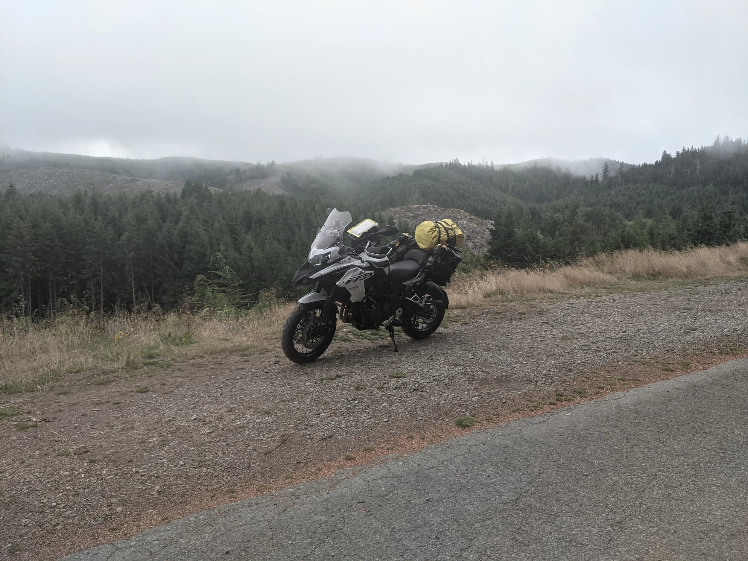 South Beach to Hoh Rainforest
This is the second installment of my trip log of my first overnight trip with the new Benelli TRK502X, doing 7 nights / 8 days from Portland, up the Olympic Peninsula, over to Bellingham and then finally to Orcas Island.
Day 3Planned Destination: Forks or La Push
Actual Destination: Hoh Rainforest Campground
Planned / Actual Accommodation: Camping
Planned / Actual Miles: 100 / 111
Planned Route: Follow the Oly Ride Guide Day Three route published by ADV Pulse, and camp somewhere near Forks or La PushRoute NotesAfter breaking camp I headed south to Queets to get gas and then back up US 101 to the store at Kalaloch to buy a sandwich for lunch for the day and pick up a few beers for the evening. I’d actually had trouble finding a place that was open and that sold beer the night before, so I was going into this day better prepared.
Today’s route was planned to be basically all of the Day 3 section of the ADV Pulse’s Olympic Peninsula route. No specific place planned to camp. I’d just find something when I was done for the day. The day started out well, and I got my first introduction to gravel roads and gravel two track on the TRK. After my experience on the WABDR on the Quota (which I haven’t written about, but I crashed hard; the Quota is in the garage patiently waiting to be rehabbed now), I was taking things slow and easy. The TRK isn’t that much lighter than the Quota, even though it’s half a liter smaller engine-wise, and I’m not sure yet if I can pick it up, so I didn’t want to get too excited and get myself into trouble again. Plus, I’m running the 80/10 Metzler Tourance tires that came on the bike; slow and easy.
I did build some confidence, but I never pushed hard. I thought about this a lot as I was riding actually. I mean, I could have pushed a lot harder. Why wasn’t I? The answer is simple. For me, adventure motorcycling (well, life in general) is about making moments. It’s about stringing together as many great memories as I can while I still can. I’ll remember the great views I “discover” along the way. I’ll remember the interesting people I meet. I’ll remember the trip. But I won’t remember if I pushed hard on any given day or not. I just don’t care about that anymore. Plus, when riding alone, you’re alone if you get into trouble. Better to go easy and get there in one piece.I did run into one issue along the way; the C-2000 road was closed. It appeared that my planned route was closed for the season, which hadn’t been noted in the ride guide. So, I backtracked to the Hoh Mainline Road and rejoined the planned route where Mainline meets Maple Creek Rd. I discovered later, upon closer inspection, that I’d actually missed a turn off of C-2000 (onto a road that isn’t labeled on the map) just before the road closure. Not sure how I rode past that turnoff twice without seeing it. So be it. I have an excuse to go back and do that again. It was all still great riding. Camp NotesIt’s been a while since I camped on the ground on a thin air pad, and it wasn’t really agreeing with me anymore; I hand’t slept well the last two nights. By the time I got to the Hoh Visitor Center I was tired and ready to be done. The Hoh Campground is reservation only, and there were no sites available when I was planning the trip. But, there was a sign at the visitor center beckoning visitors to inquire at the campground desk if there were any camp sites available, so that’s what I did.
I lucked out; there were several sites available. I got a great site with a somewhat secluded tent space (though I worried about tent flooding as it was several feet lower than the surrounding land; fortunately there was no rain). I met a young couple who were actually sleeping in their car. Ouch. They didn’t really know how to camp. She was from Texas but had recently moved to Eugene, Oregon, and he was from England somewhere. She said she was an artist and she’d never done anything like this before. In the morning, she came over and asked if I had a way to heat water so they could have coffee. I obliged.
The guy next to me also came over in the morning and offered me coffee. Motorcycle travel really brings out the friendliness from people in RV trailers. Gear NotesI had noticed a store on the road up to the Hoh visitor center. I rode back to see if they had any food, as I was running low. I hadn’t really been thinking ahead and replenishing food before I needed it, and I was worried that I’d run out. The store had several freeze dried meals, so I picked up something for dinner and some scrambled eggs for breakfast, leaving the food I already had for the next day.
I didn’t have a ton of room for food as I was storing all food (and smelly items) in a small Bare Boxer bear canister from Gossamer Gear. Since I wasn’t running with hard case luggage, I felt I needed a way to keep the rodents (and bears) at bay. The Bare Boxer has room for two days of dinners and breakfasts (freeze dried) plus coffee, some extra oat meal, energy bars, my toothbrush & paste, the dish soap, DEET, and my Whisperlite stove. It worked out quite well the entire trip, actually. Anything that might attract rodents or bears went in the canister, and the canister fit nicely at the bottom of my left-side Wolfman 20L rolie.
As noted above, sleeping on the ground on a thin air pad doesn’t do it for me anymore. My back killed me on the third night, and I did not sleep well at all. I have identified the solution, however. The Helinox Lite Cot. It packs smaller than my air pad and is now on my Christmas wish list. The only downside would be cold weather camping; will need a thin foam pad to provide insulation for temps below freezing, likely.
